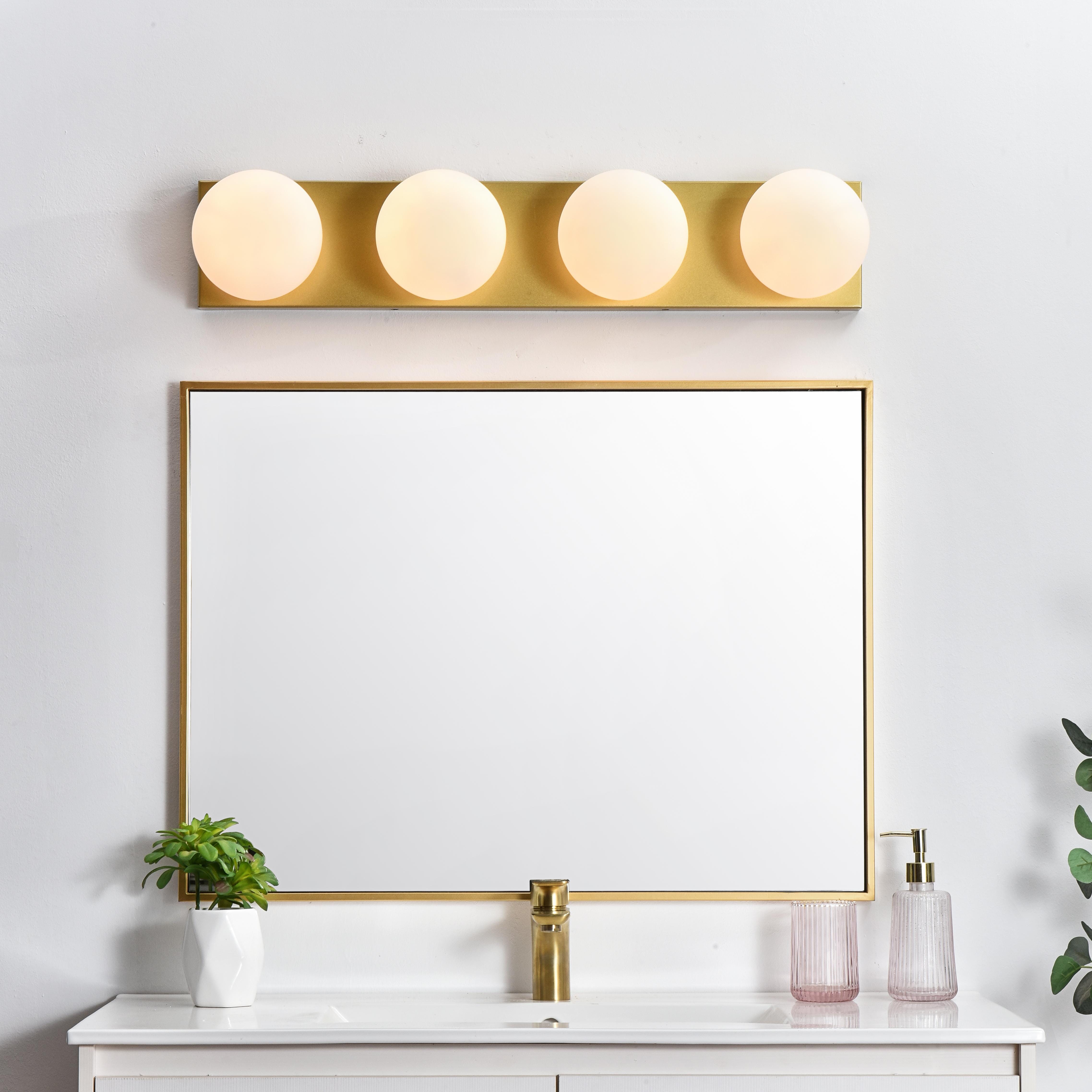 An art deco staple with a modern update in this stunning light bath rectangular base. Made of iron, this simple yet sophisticated design showcases a clean-cut rectangle backplate with an oversize frosted glass to balance the look. Rated for use in damp locations, this will work perfectly over a vanity using 40W bulbs ( not included). Compatible with dimmers, so you'll have the right amount of light in any given time of the day. Collection: Jaylin Rooms: Bathroom Finish: Brass and frosted white Glass: frosted white Width: 31.00" Height: 6.00" Weight: 7.00 lb Extension from Wall: 7.00" Wire: 8" Black and White Canopy: 30.7"x5.9"x1" Number of Bulbs: 4 Maximum Wattage: 40.00 W Bulb Type: E12 Bulb Base: E12 Dimmable Voltage: 110.00 V Material: Iron and Glass Country of Origin: China Safety Listing: ETL Safety Rating: Damp Title 20 Title 24 Manufacturer Warranty: 1 year limited - alternate view