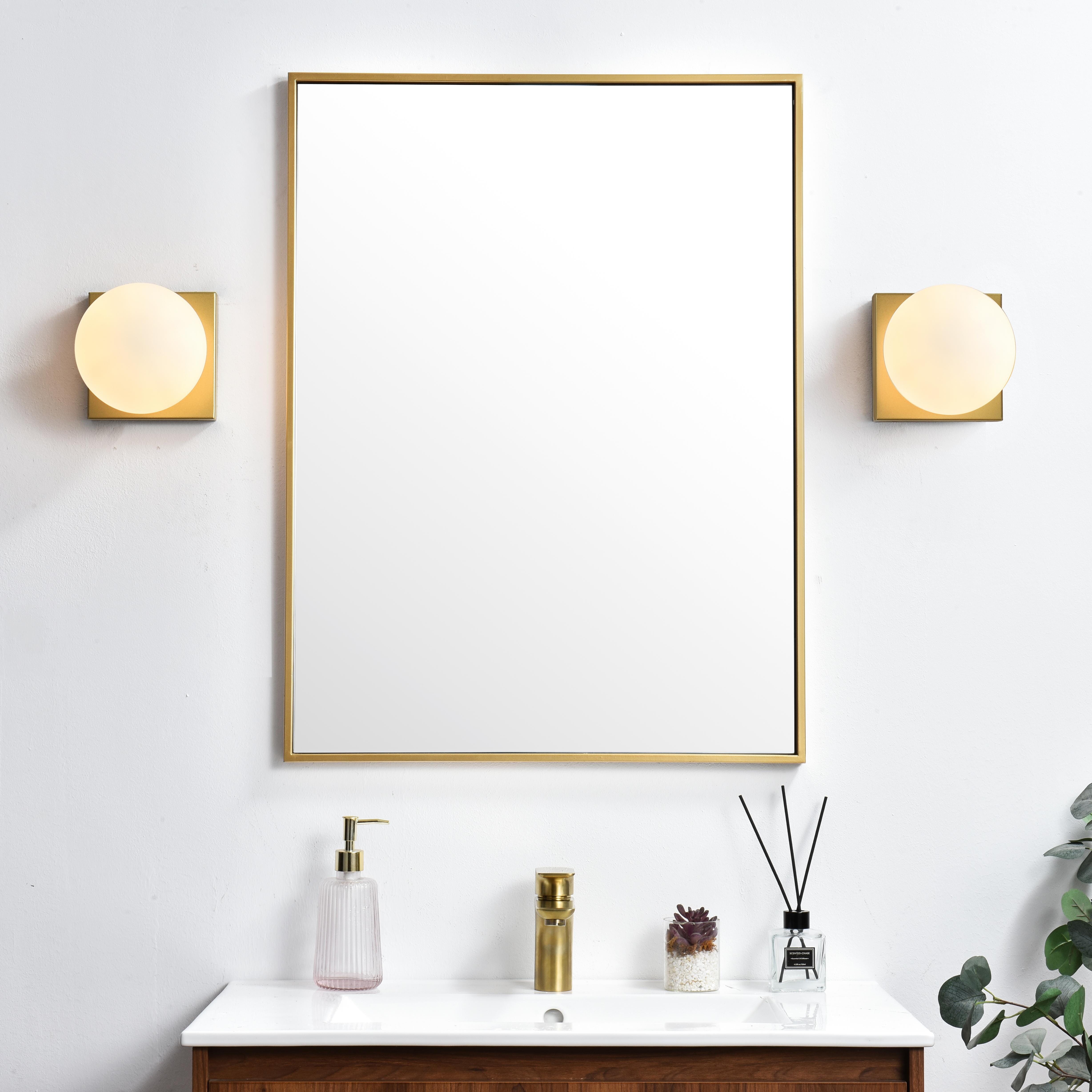 An art deco staple with a modern update in this stunning light bath square base. Made of iron, this simple yet sophisticated design showcases a clean-cut square backplate with an oversize frosted glass to balance the look. Rated for use in damp locations, this will work perfectly over a vanity using 40W bulbs ( not included). Compatible with dimmers, so you'll have the right amount of light in any given time of the day. Collection: Jaylin Rooms: Bathroom Finish: Brass and frosted white Glass: frosted white Width: 6.00" Height: 6.00" Weight: 2.00 lb Extension from Wall: 7.00" Wire: 8" Black and White Canopy: 5.9"x5.9"x1" Number of Bulbs: 1 Maximum Wattage: 40.00 W Bulb Type: E12 Bulb Base: E12 Dimmable Voltage: 110.00 V Material: Iron and Glass Country of Origin: China Safety Listing: ETL Safety Rating: Damp Title 20 Title 24 Manufacturer Warranty: 1 year limited - alternate view
