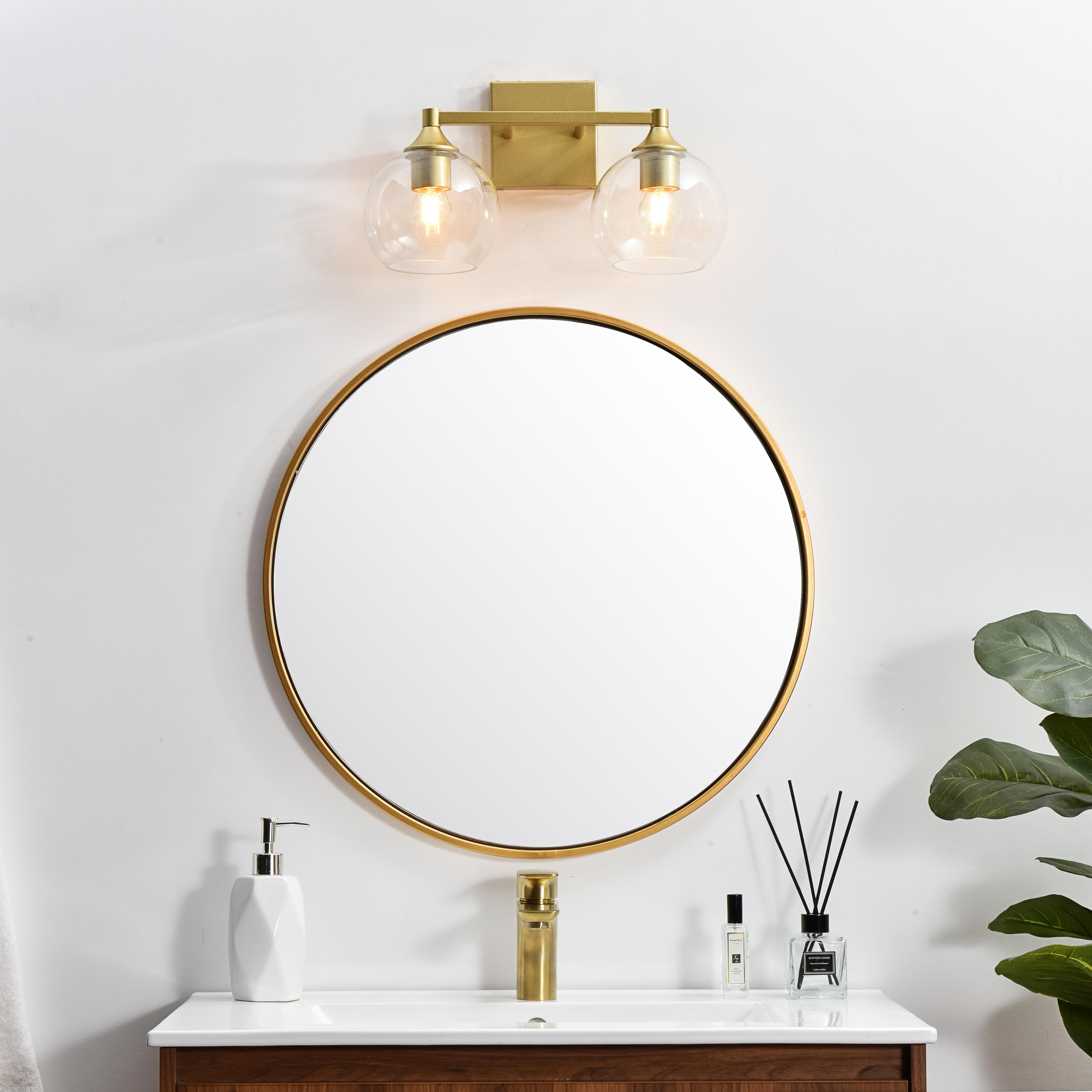 Defined by a sleek metal arm extends to suspend the clear pear-shaped glass shade. A contemporary stunner, it shows off the straight line details from the backplate and the streamline thick metal arm. Compatible with dimmers, so you'll have the right amount of light in any given time of the day. Completely versatile, you can place this wall light as an uplight or downlight. Rated for use in damp locations, this will work perfectly over a vanity in your bathroom. Collection: Foster Rooms: Bathroom Finish: Brass and Clear Glass: Clear Width: 16.00" Height: 9.00" Weight: 3.00 lb Extension from Wall: 8.00" Wire: 8" Black and White Canopy: 4.7"x4.7"x0.8" Number of Bulbs: 2 Maximum Wattage: 40.00 W Bulb Type: E26 Bulb Base: E26 Dimmable Voltage: 110.00 V Material: Iron and Glass Country of Origin: China Safety Listing: ETL Safety Rating: Damp Title 20 Title 24 Manufacturer Warranty: 1 year limited - alternate view