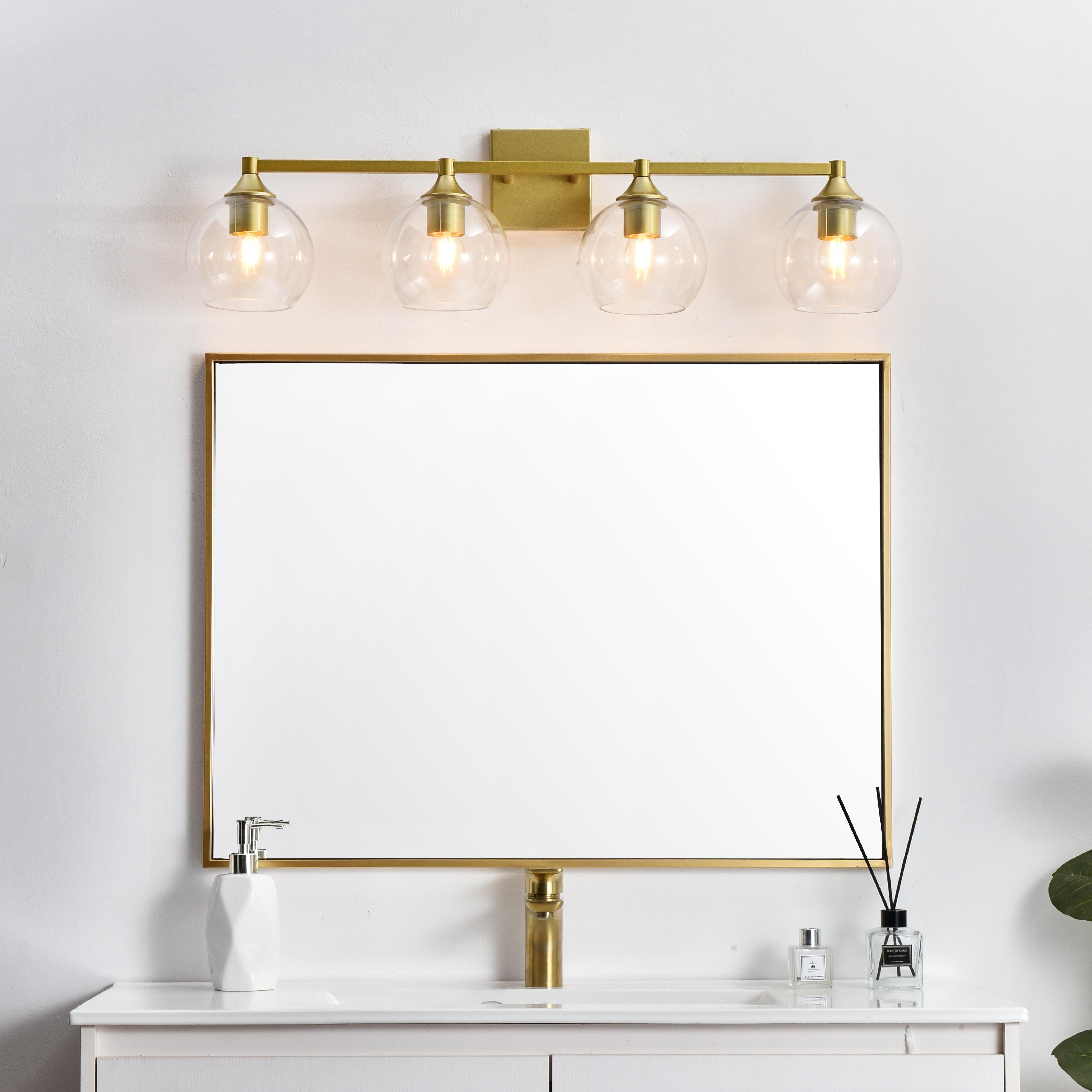 Defined by a sleek metal arm extends to suspend the clear pear-shaped glass shade. A contemporary stunner, it shows off the straight line details from the backplate and the streamline thick metal arm. Compatible with dimmers, so you'll have the right amount of light in any given time of the day. Completely versatile, you can place this wall light as an uplight or downlight. Rated for use in damp locations, this will work perfectly over a vanity in your bathroom. Collection: Foster Rooms: Bathroom Finish: Brass and Clear Glass: Clear Width: 33.00" Height: 9.00" Weight: 5.00 lb Extension from Wall: 8.00" Wire: 8" Black and White Canopy: 4.7"x4.7"x0.8" Number of Bulbs: 4 Maximum Wattage: 40.00 W Bulb Type: E26 Bulb Base: E26 Dimmable Voltage: 110.00 V Material: Iron and Glass Country of Origin: China Safety Listing: ETL Safety Rating: Damp Title 20 Title 24 Manufacturer Warranty: 1 year limited - alternate view