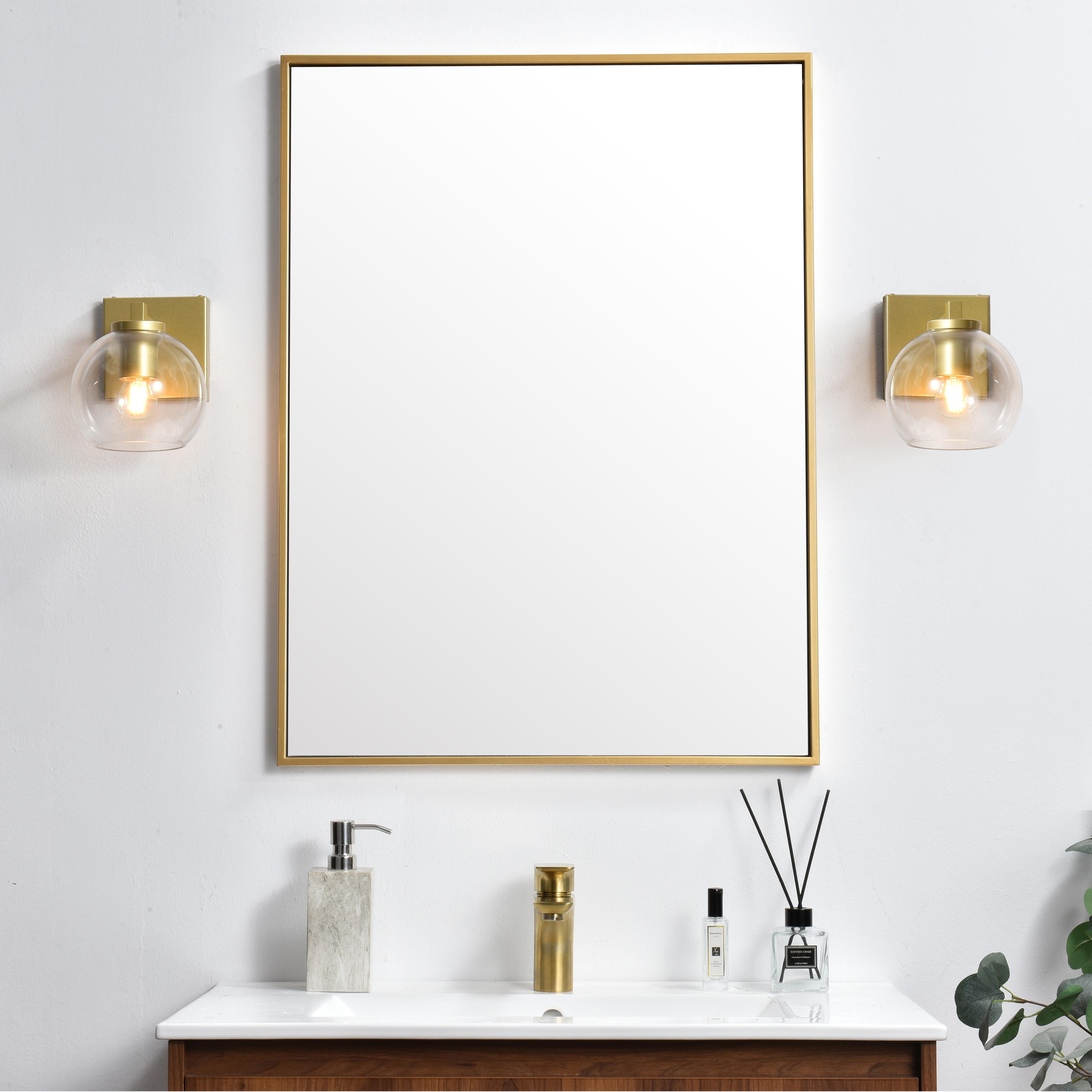 Defined by a sleek metal arm extends to suspend the clear pear-shaped glass shade. A contemporary stunner, it shows off the straight line details from the backplate and the streamline thick metal arm. Compatible with dimmers, so you'll have the right amount of light in any given time of the day. Completely versatile, you can place this wall light as an uplight or downlight. Rated for use in damp locations, this will work perfectly over a vanity in your bathroom. Collection: Foster Rooms: Bathroom Finish: Brass and Clear Glass: Clear Width: 6.00" Height: 9.00" Weight: 2.00 lb Extension from Wall: 8.00" Wire: 8" Black and White Canopy: 4.7"x4.7"x0.8" Number of Bulbs: 1 Maximum Wattage: 40.00 W Bulb Type: E26 Bulb Base: E26 Dimmable Voltage: 110.00 V Material: Iron and Glass Country of Origin: China Safety Listing: ETL Safety Rating: Damp Title 20 Title 24 Manufacturer Warranty: 1 year limited - alternate view