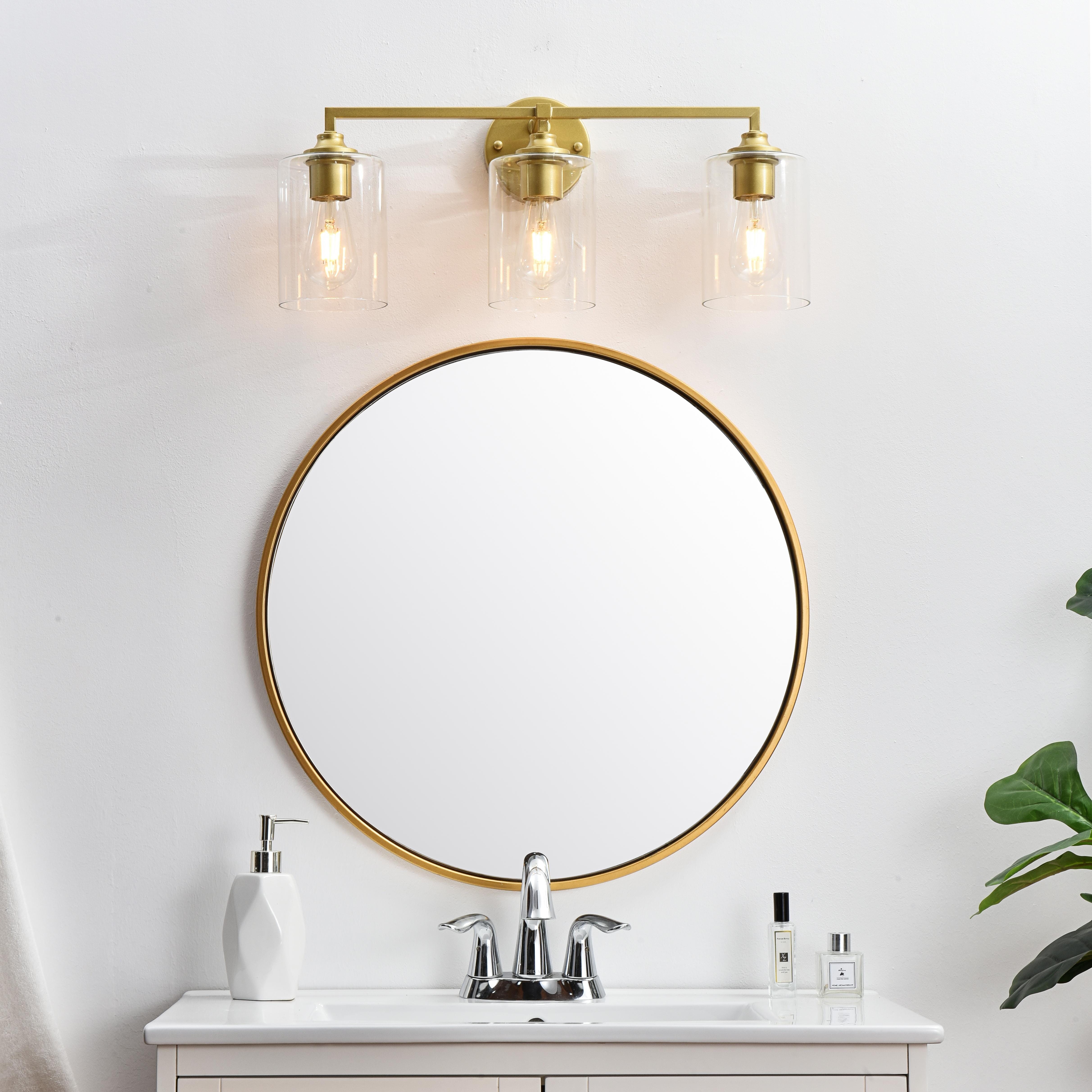 The artful allure of modern sculpture with the function of a light fixture. This glass and metal combination is a perfect example of a modern design. Compatible with dimmers, so you'll have the right amount of light in any given time of the day. Available in multiple finishes. Completely versatile, you can place this wall light as an uplight or downlight. Collection: Mayson Rooms: Bathroom Finish: Brass and Clear Glass: Clear Width: 23.00" Height: 10.00" Weight: 4.00 lb Extension from Wall: 7.00" Wire: 8" Black and White Canopy: 4.7"x1"x4.7" Number of Bulbs: 3 Maximum Wattage: 40.00 W Bulb Type: E26 Bulb Base: E26 Dimmable Voltage: 110.00 V Material: Iron and Glass Country of Origin: China Safety Listing: ETL Safety Rating: Damp Title 20 Title 24 Manufacturer Warranty: 1 year limited - alternate view