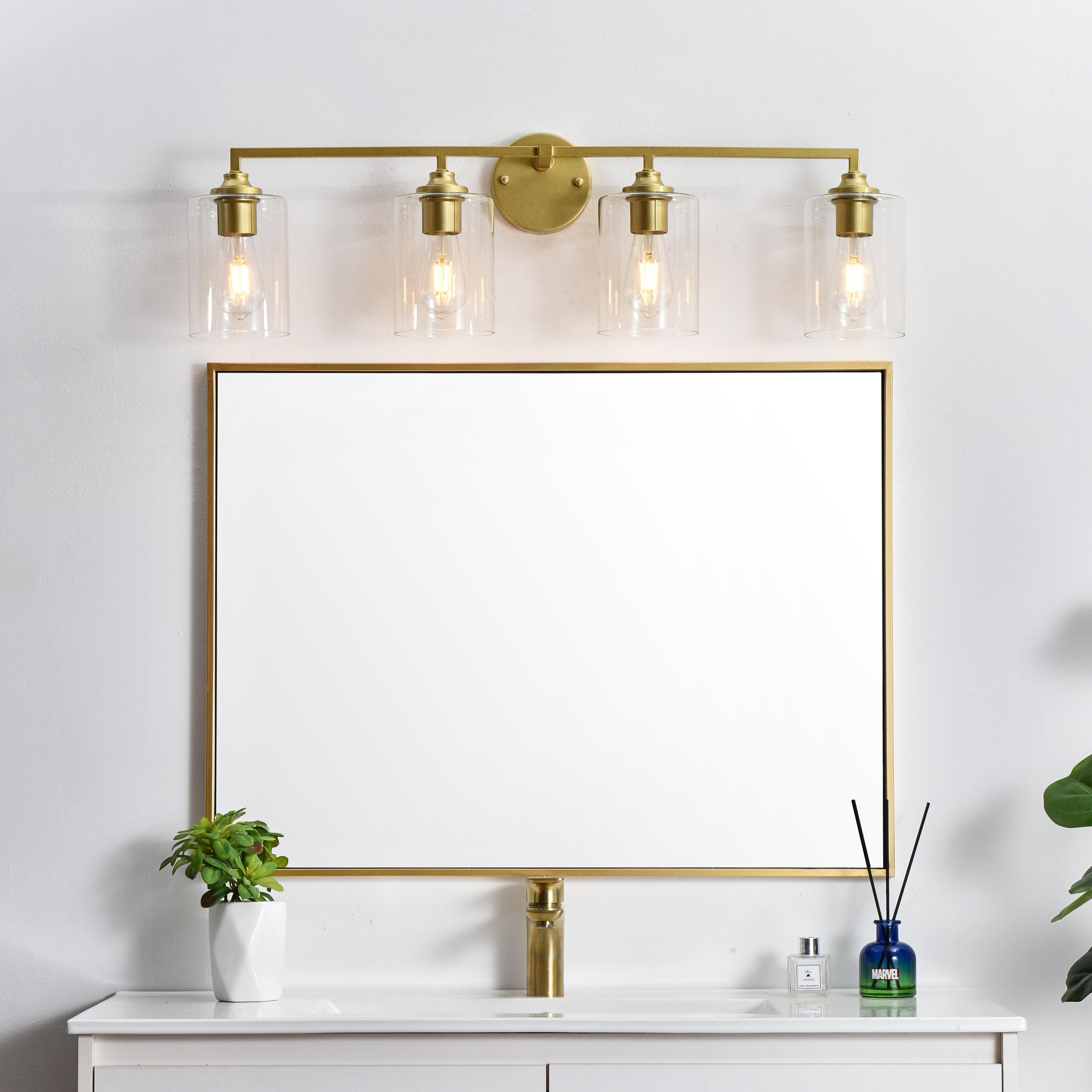 The artful allure of modern sculpture with the function of a light fixture. This glass and metal combination is a perfect example of a modern design. Compatible with dimmers, so you'll have the right amount of light in any given time of the day. Available in multiple finishes. Completely versatile, you can place this wall light as an uplight or downlight. Collection: Mayson Rooms: Bathroom Finish: Brass and Clear Glass: Clear Width: 33.00" Height: 10.00" Weight: 5.00 lb Extension from Wall: 7.00" Wire: 8" Black and White Canopy: 4.7"x1"x4.7" Number of Bulbs: 4 Maximum Wattage: 40.00 W Bulb Type: E26 Bulb Base: E26 Dimmable Voltage: 110.00 V Material: Iron and Glass Country of Origin: China Safety Listing: ETL Safety Rating: Damp Title 20 Title 24 Manufacturer Warranty: 1 year limited - alternate view