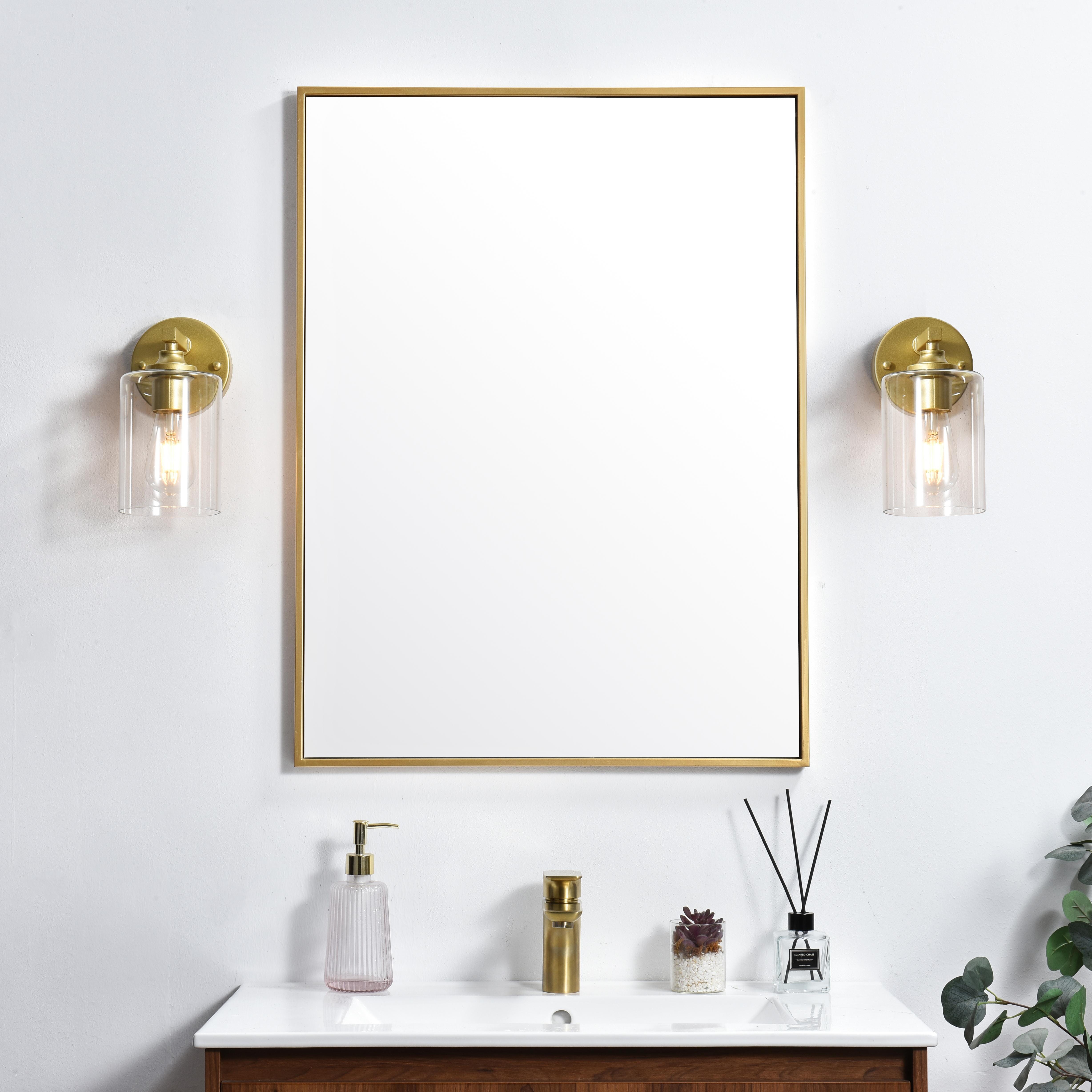 The artful allure of modern sculpture with the function of a light fixture. This glass and metal combination is a perfect example of a modern design. Compatible with dimmers, so you'll have the right amount of light in any given time of the day. Available in multiple finishes. Completely versatile, you can place this wall light as an uplight or downlight. Collection: Mayson Rooms: Bathroom Finish: Brass and Clear Glass: Clear Width: 5.00" Height: 10.00" Weight: 2.00 lb Extension from Wall: 7.00" Wire: 8" Black and White Canopy: 4.7"x1"x4.7" Number of Bulbs: 1 Maximum Wattage: 40.00 W Bulb Type: E26 Bulb Base: E26 Dimmable Voltage: 110.00 V Material: Iron and Glass Country of Origin: China Safety Listing: ETL Safety Rating: Damp Title 20 Title 24 Manufacturer Warranty: 1 year limited - alternate view