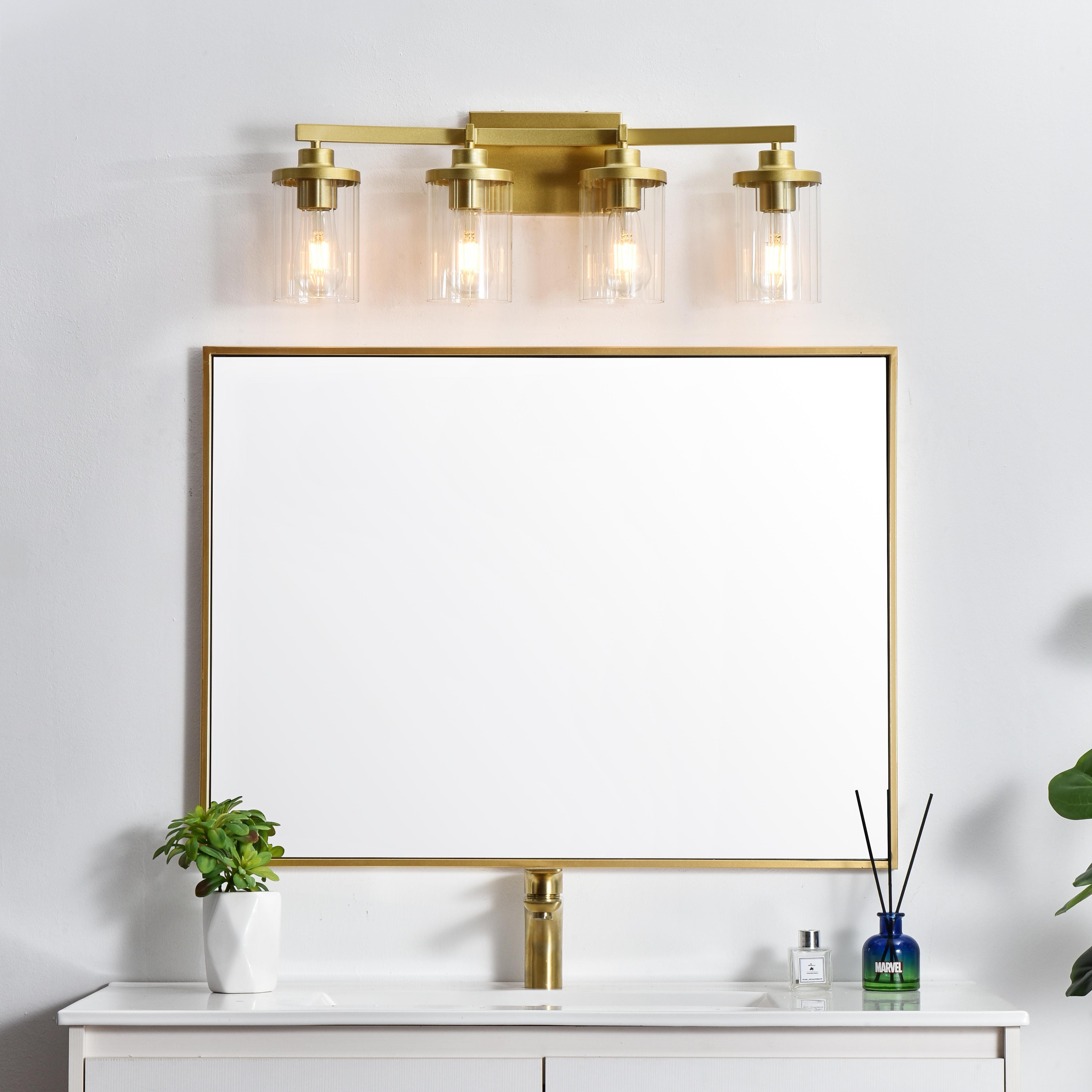 The artful allure of modern sculpture with the function of a light fixture. This glass and metal combination is a perfect example of a modern design. Compatible with dimmers, so you'll have the right amount of light in any given time of the day. Available in multiple finishes. Completely versatile, you can place this wall light as an uplight or downlight. Collection: Saanvi Rooms: Bathroom Finish: Brass and Clear Glass: Clear Width: 25.00" Height: 10.00" Weight: 5.00 lb Extension from Wall: 6.00" Wire: 8" Black and White Canopy: 7.1"x4.7"x0.8" Number of Bulbs: 4 Maximum Wattage: 40.00 W Bulb Type: E26 Bulb Base: E26 Dimmable Voltage: 110.00 V Material: Iron and Glass Country of Origin: China Safety Listing: ETL Safety Rating: Damp Title 20 Title 24 Manufacturer Warranty: 1 year limited - alternate view