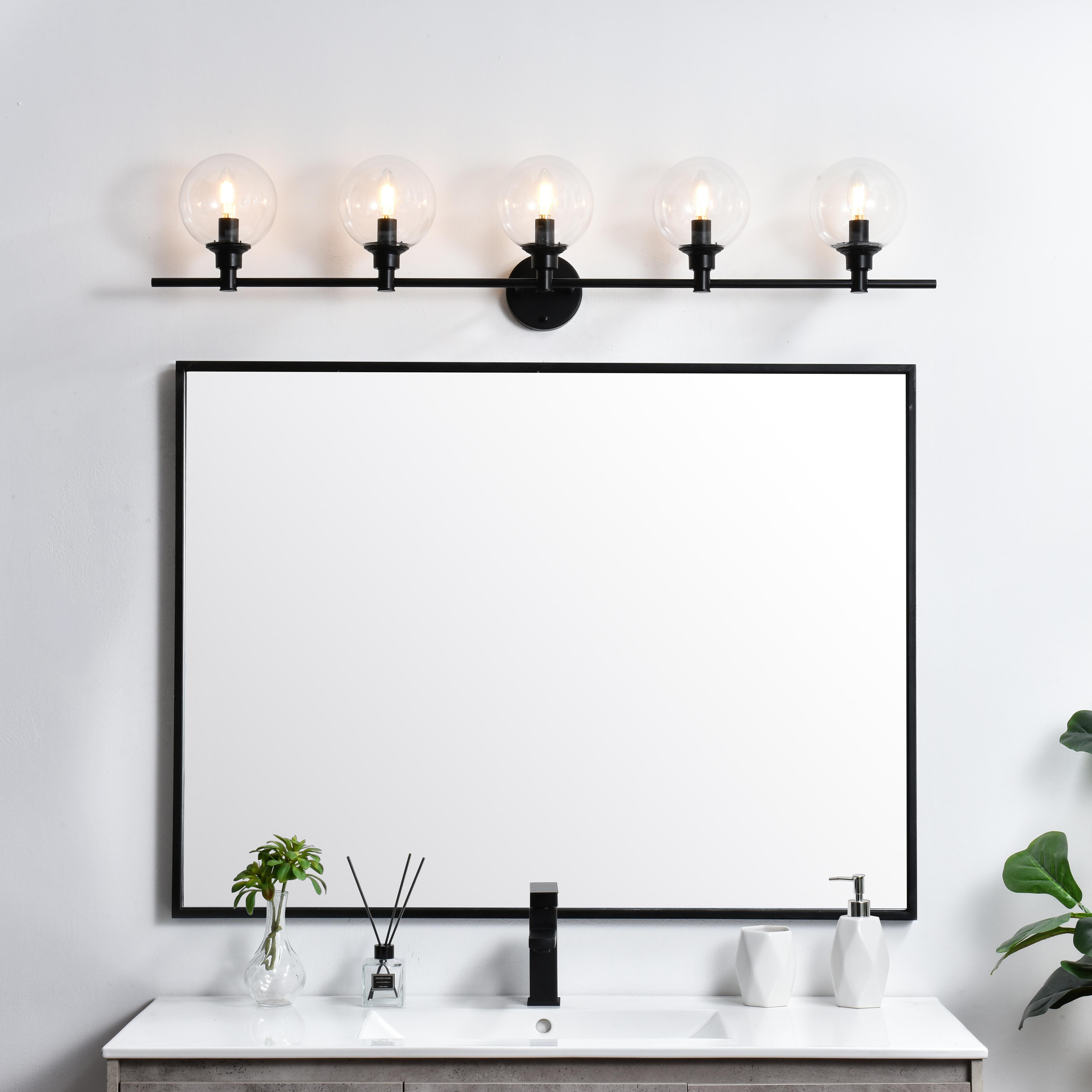 Specification Sheet
Dimensions
Length: 7.7"
Width: 47"
Height: 10"
Extension: 8"
Wire Length: 8"
Depth: 8"
Specifications
Assembly Required: Yes
Bulb Included: No
#N/A
Dimmable: Yes
Distressed Finish: No
Dry/Wet/Damp: Damp
ETL: yes
Finish (Color): Black and Clear
Fixture Material: Iron and Glass
Hardware Finish: Black
Harware Material: Iron
Max/Nominal Watt: 200W
Number of Lights: 5
Product Type: Vanity Lights
Product Warranty: 1 year limited
Socket Type: E12
Voltage: 110V
Wattage/Bulb: 40W
Weight: 8
Wire Included: Yes
Shipment type: Small Parcel
US Shipping Cost: $29.00 - alternate view