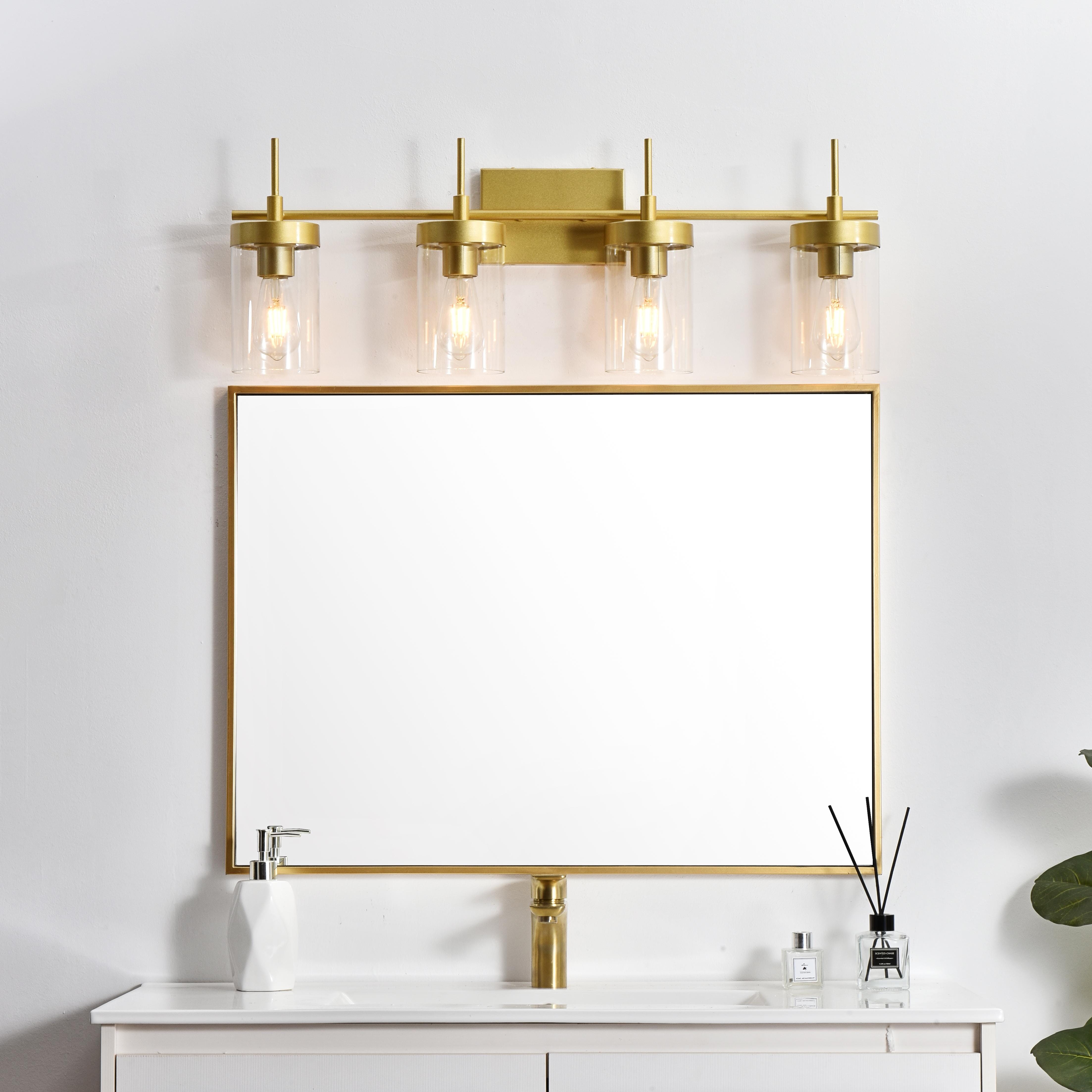Defined by curved metal arm extends to suspend the clear bell glass shade. A contemporary stunner, it shows off the straight line details from the backplate and the streamline thin metal arm. Compatible with dimmers, so you'll have the right amount of light in any given time of the day. Completely versatile, you can place this wall light as an uplight or downlight. Rated for use in damp locations, this will work perfectly over a vanity in your bathroom. Collection: Benny Rooms: Bathroom Finish: Brass and Clear Glass: Clear Width: 32.00" Height: 11.00" Weight: 7.00 lb Extension from Wall: 6.00" Wire: 8" Black and White Canopy: 7.1"x4.7"x0.8" Number of Bulbs: 4 Maximum Wattage: 40.00 W Bulb Type: E26 Bulb Base: E26 Dimmable Voltage: 110.00 V Material: Iron and Glass Country of Origin: China Safety Listing: ETL Safety Rating: Damp Title 20 Title 24 Manufacturer Warranty: 1 year limited - alternate view