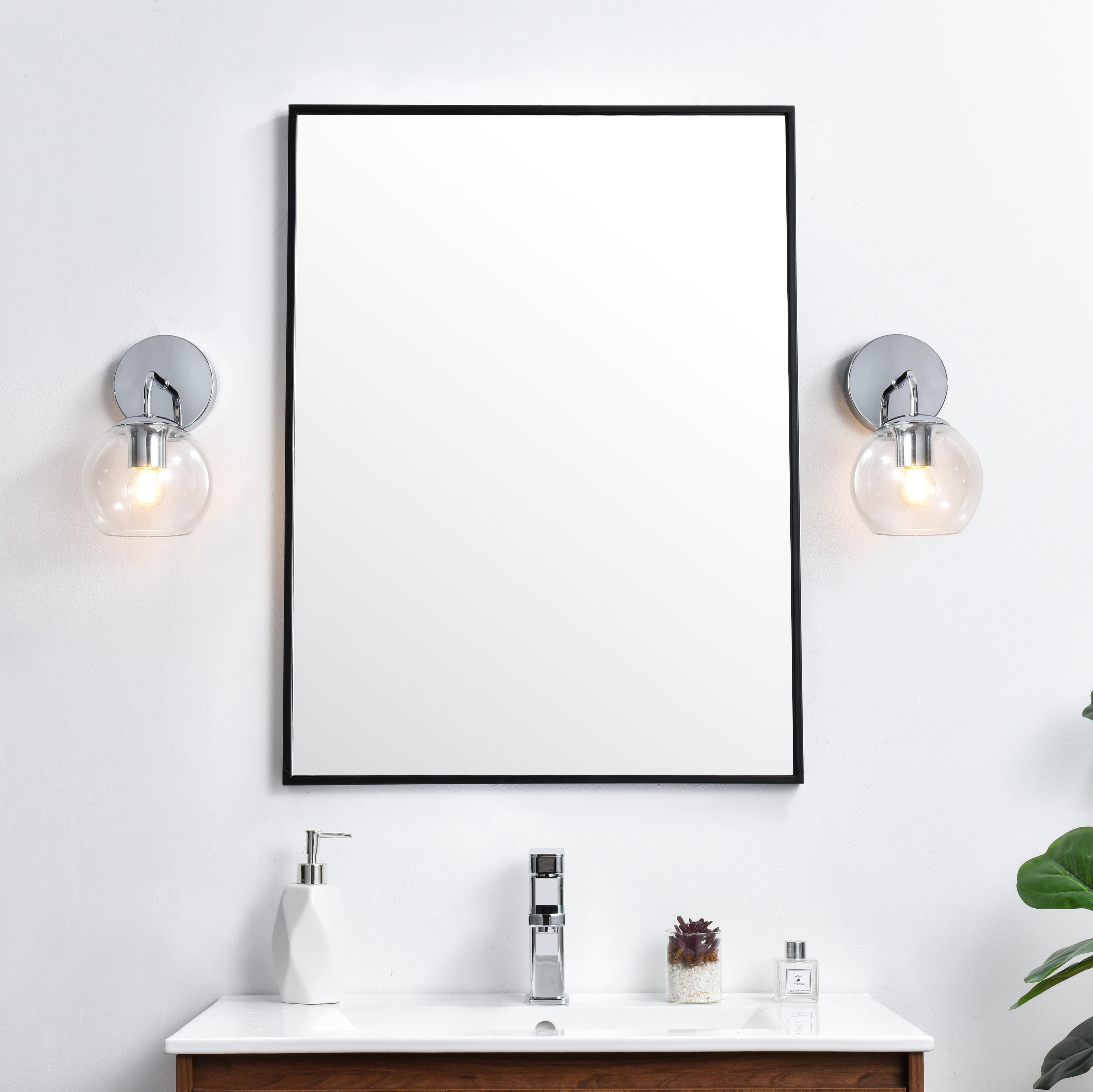 A modern twist on a traditional design, this vanity light is perfect for sprucing up your bathroom. Rated for use in damp locations, this iron fixture features a round backplate, curved arms, and orb accents. Completely versatile, you can place this wall light as an uplight or downlight. Rated for use in damp locations, this will work perfectly over a vanity in your bathroom. Collection: Genesis Rooms: Bathroom Finish: Chrome and Clear Glass: Clear Width: 6.00" Height: 10.00" Weight: 1.00 lb Extension from Wall: 8.00" Wire: 8" Black and White Canopy: 4.7"x1"x4.7" Number of Bulbs: 1 Maximum Wattage: 40.00 W Bulb Type: E26 Bulb Base: E26 Dimmable Voltage: 110.00 V Material: Iron and Glass Country of Origin: China Safety Listing: ETL Safety Rating: Damp Title 20 Title 24 Manufacturer Warranty: 1 year limited - alternate view