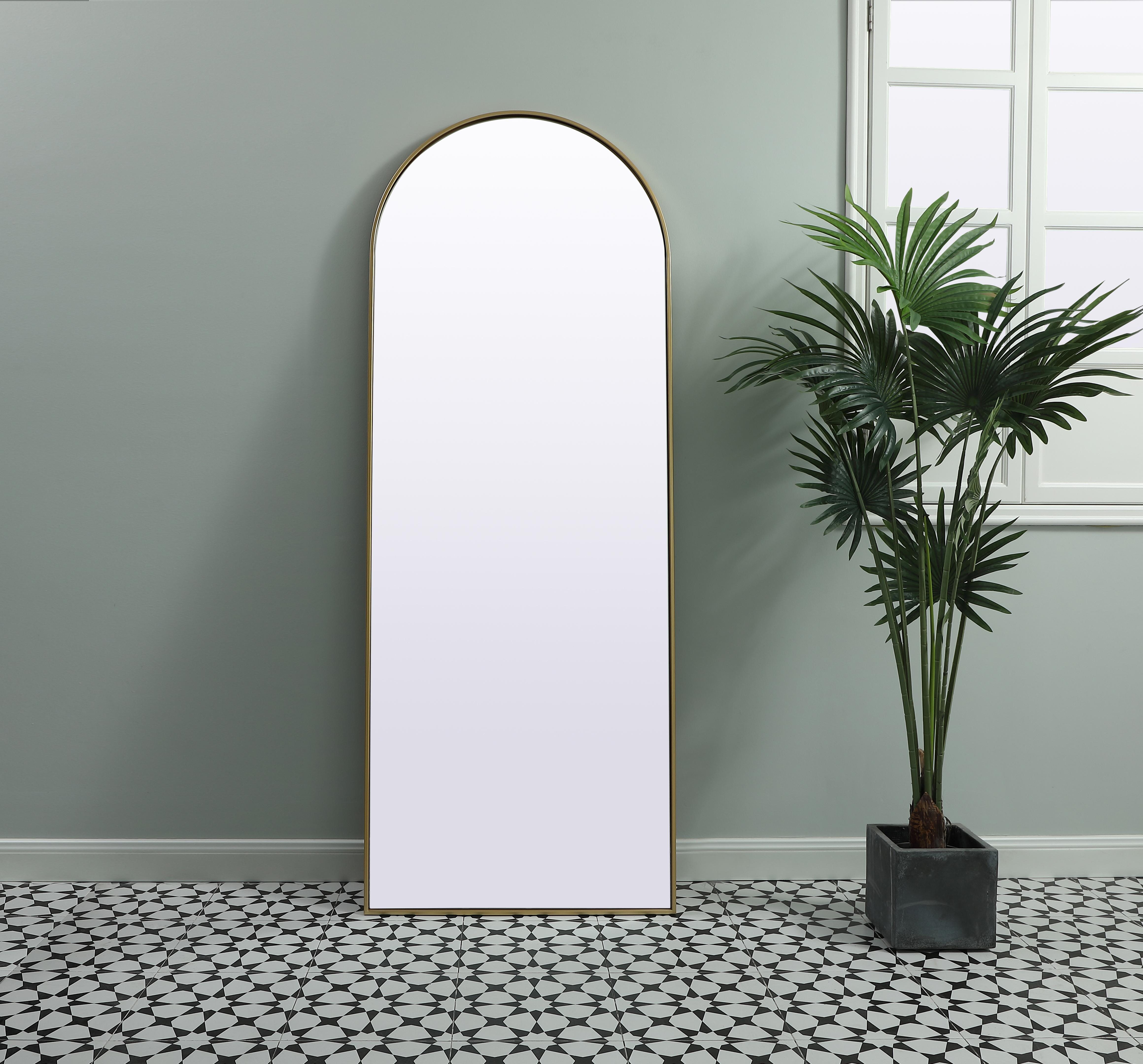 Instantly open up any space in your home with this minimalist floor mounted mirror. Crafted of metal, this mirror strikes a round silhouette. Its slender, clean-lined frame sports a classic finish, while the glass mirror within features a flat, for a brilliant reflection, letting the light bounce off to expand your space. Designed in an arch shape, this metal-frame mirror showcases in the three available satin finishes in black, brass, or silver. Mount this work of art in any room of your choice or lean against the wall for added visual impact. Collection: Ayra Finish: Brass Width: 28.00" Height: 74.00" Length: 74.00" Weight: 38.00 lb Material: iron and MDF Country of Origin: China Manufacturer Warranty: 1 year limited - alternate view