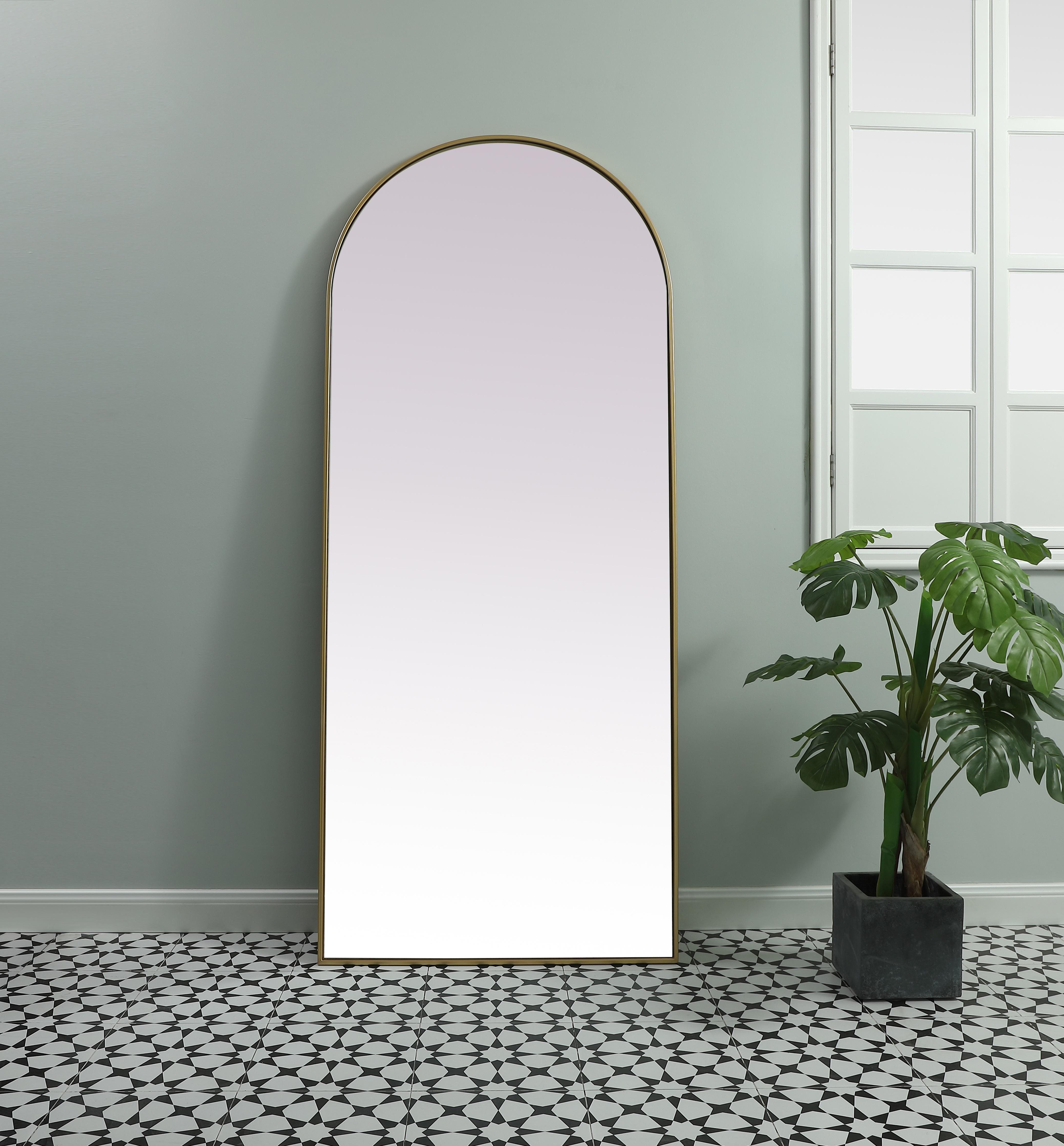 Instantly open up any space in your home with this minimalist floor mounted mirror. Crafted of metal, this mirror strikes a round silhouette. Its slender, clean-lined frame sports a classic finish, while the glass mirror within features a flat, for a brilliant reflection, letting the light bounce off to expand your space. Designed in an arch shape, this metal-frame mirror showcases in the three available satin finishes in black, brass, or silver. Mount this work of art in any room of your choice or lean against the wall for added visual impact. Collection: Ayra Finish: Brass Width: 32.00" Height: 76.00" Length: 76.00" Weight: 44.00 lb Material: iron and MDF Country of Origin: China Manufacturer Warranty: 1 year limited - alternate view