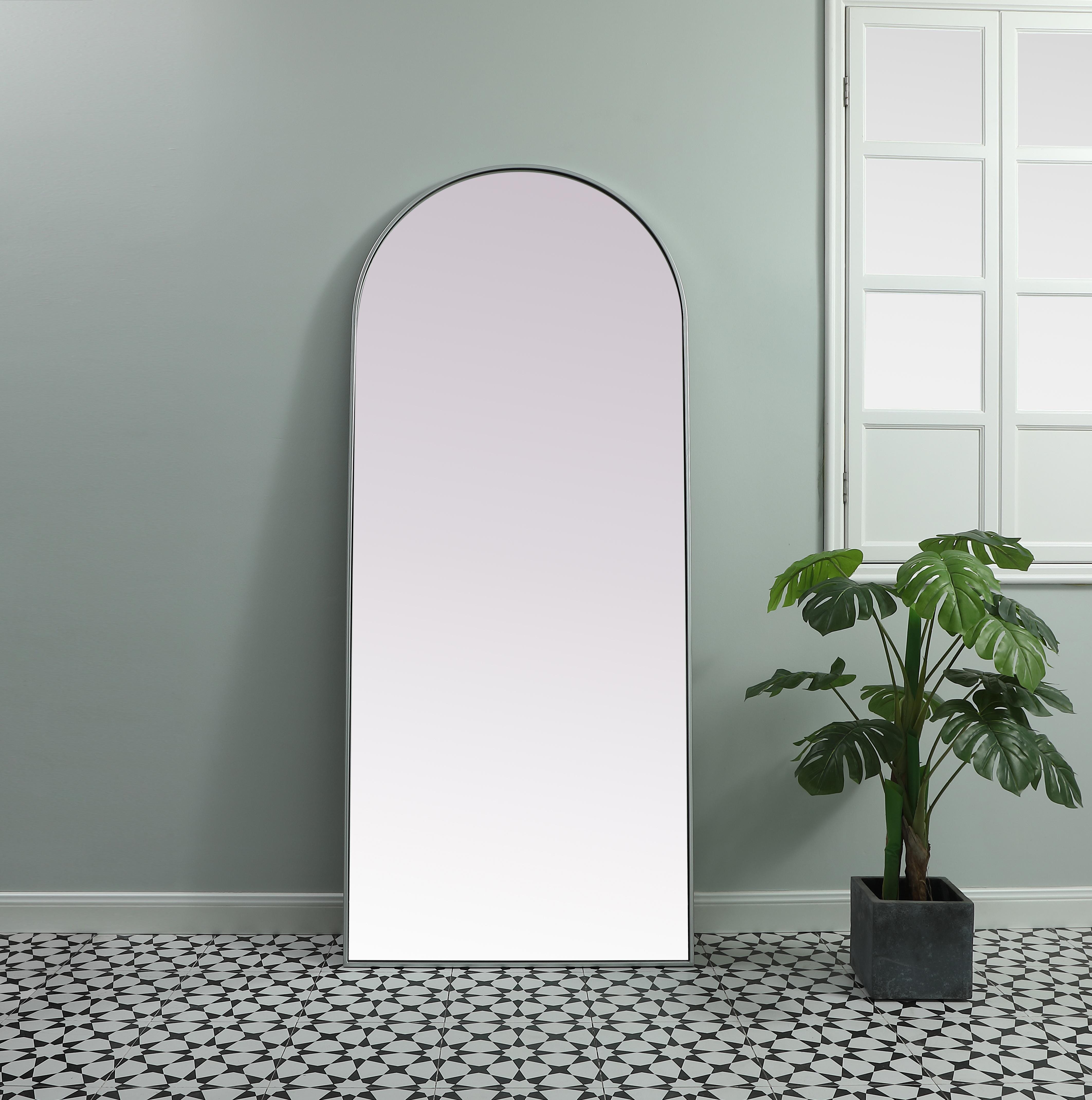 Instantly open up any space in your home with this minimalist floor mounted mirror. Crafted of metal, this mirror strikes a round silhouette. Its slender, clean-lined frame sports a classic finish, while the glass mirror within features a flat, for a brilliant reflection, letting the light bounce off to expand your space. Designed in an arch shape, this metal-frame mirror showcases in the three available satin finishes in black, brass, or silver. Mount this work of art in any room of your choice or lean against the wall for added visual impact. Collection: Ayra Finish: Silver Width: 32.00" Height: 76.00" Length: 76.00" Weight: 44.00 lb Material: iron and MDF Country of Origin: China Manufacturer Warranty: 1 year limited - alternate view