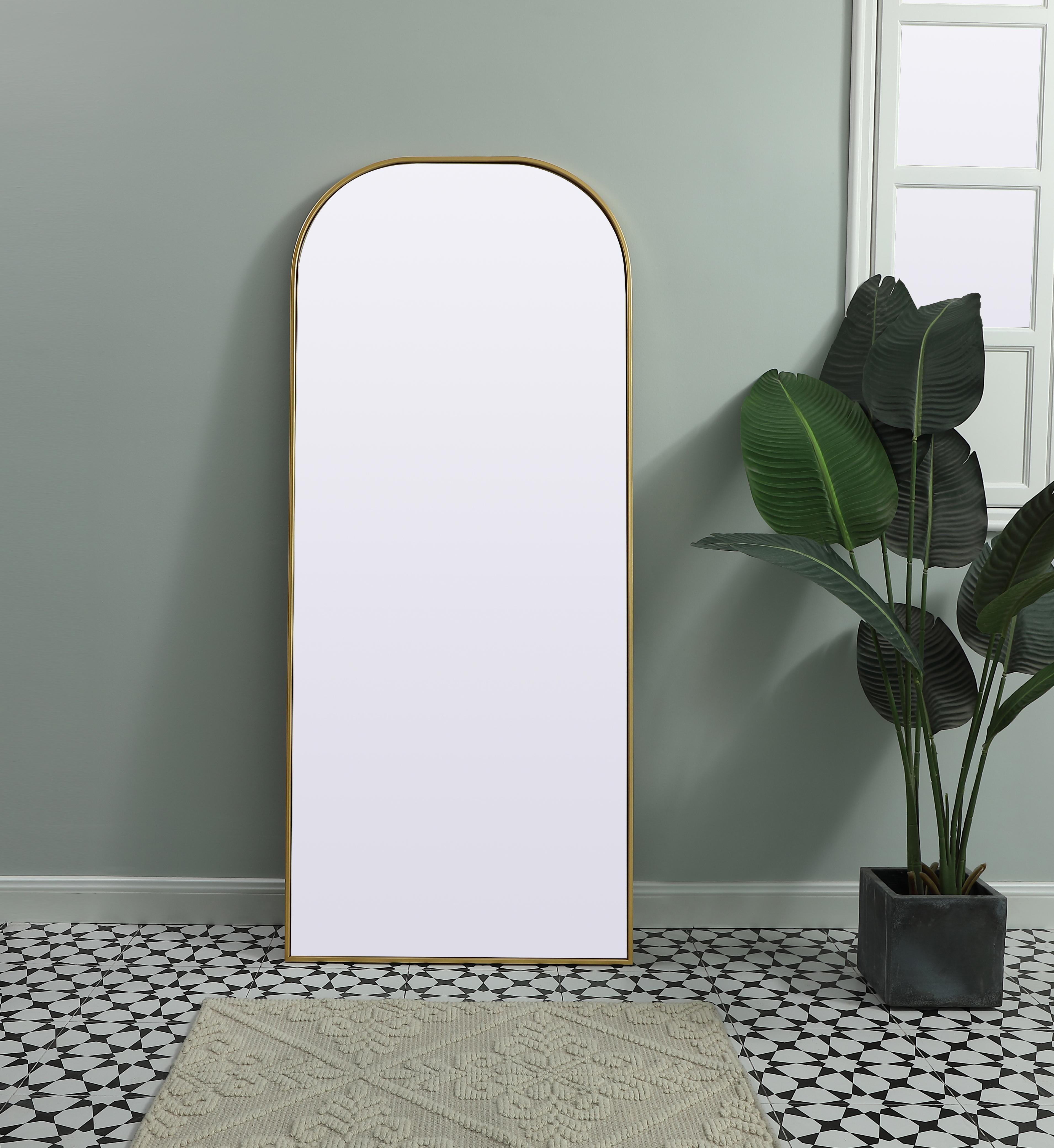 Elongated and modern, its curved profile looks great as a leaning mirror or a hanging mirror by a door. This ultra thin full-length mirror makes a practical addition to any room. Set in an iron frame, this sturdy mirror complements any room. Whether you want to create an illusion of extra space or use it as a functional accent, this mirror will make a big statement over your wall. Comes in three satin finishes in black, brass, or silver. Collection: Blaire Finish: Brass Width: 28.00" Height: 66.00" Length: 66.00" Weight: 34.00 lb Material: iron and MDF Country of Origin: China Manufacturer Warranty: 1 year limited - alternate view