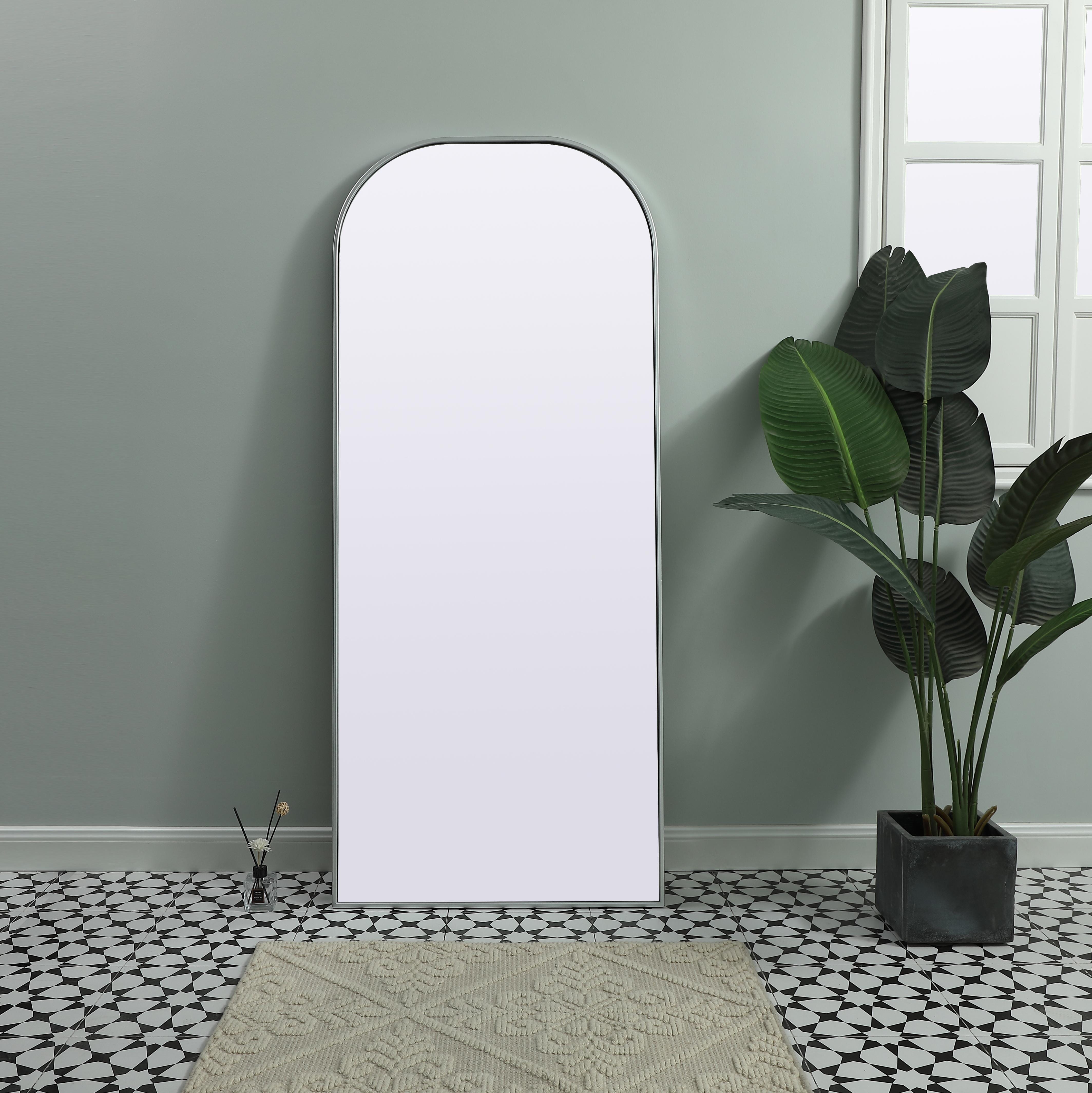 Elongated and modern, its curved profile looks great as a leaning mirror or a hanging mirror by a door. This ultra thin full-length mirror makes a practical addition to any room. Set in an iron frame, this sturdy mirror complements any room. Whether you want to create an illusion of extra space or use it as a functional accent, this mirror will make a big statement over your wall. Comes in three satin finishes in black, brass, or silver. Collection: Blaire Finish: Silver Width: 28.00" Height: 66.00" Length: 66.00" Weight: 34.00 lb Material: iron and MDF Country of Origin: China Manufacturer Warranty: 1 year limited - alternate view