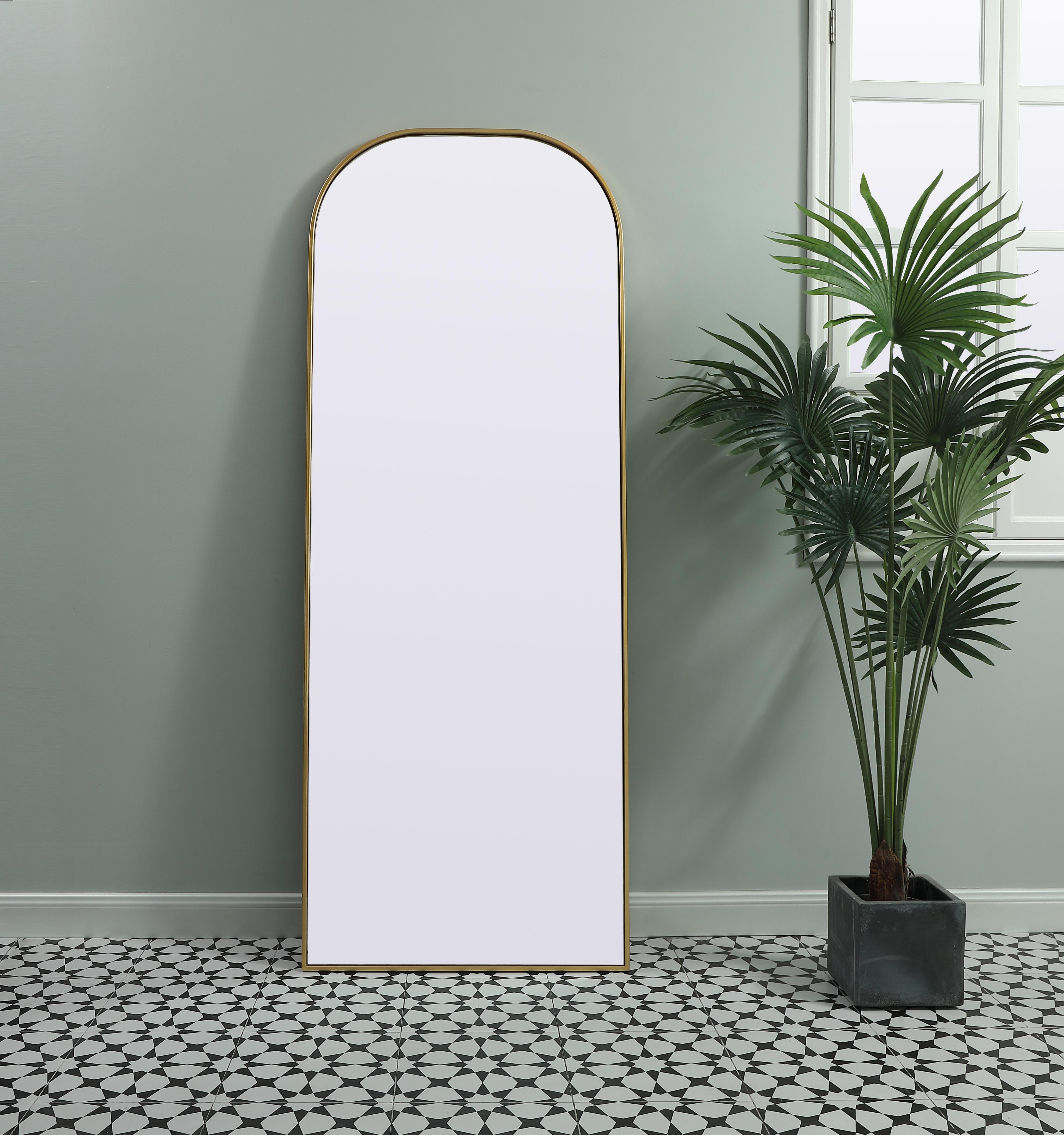 Over the mantel mirror serves an ideal décor on the mantel because it acts as an anchor piece that you can accentuate around with smaller accessories. The reflective qualities of the mirror can also make a space look bigger and brighter since it bounces light coming from your light sources. Designed with square bottom edges and rounded top, this mirror gives an unexpected twist to your typical mirror look. Select from three satin finishes in black, brass, or silver. Collection: Blaire Finish: Brass Width: 28.00" Height: 74.00" Length: 74.00" Weight: 38.00 lb Material: iron and MDF Country of Origin: China Manufacturer Warranty: 1 year limited - alternate view
