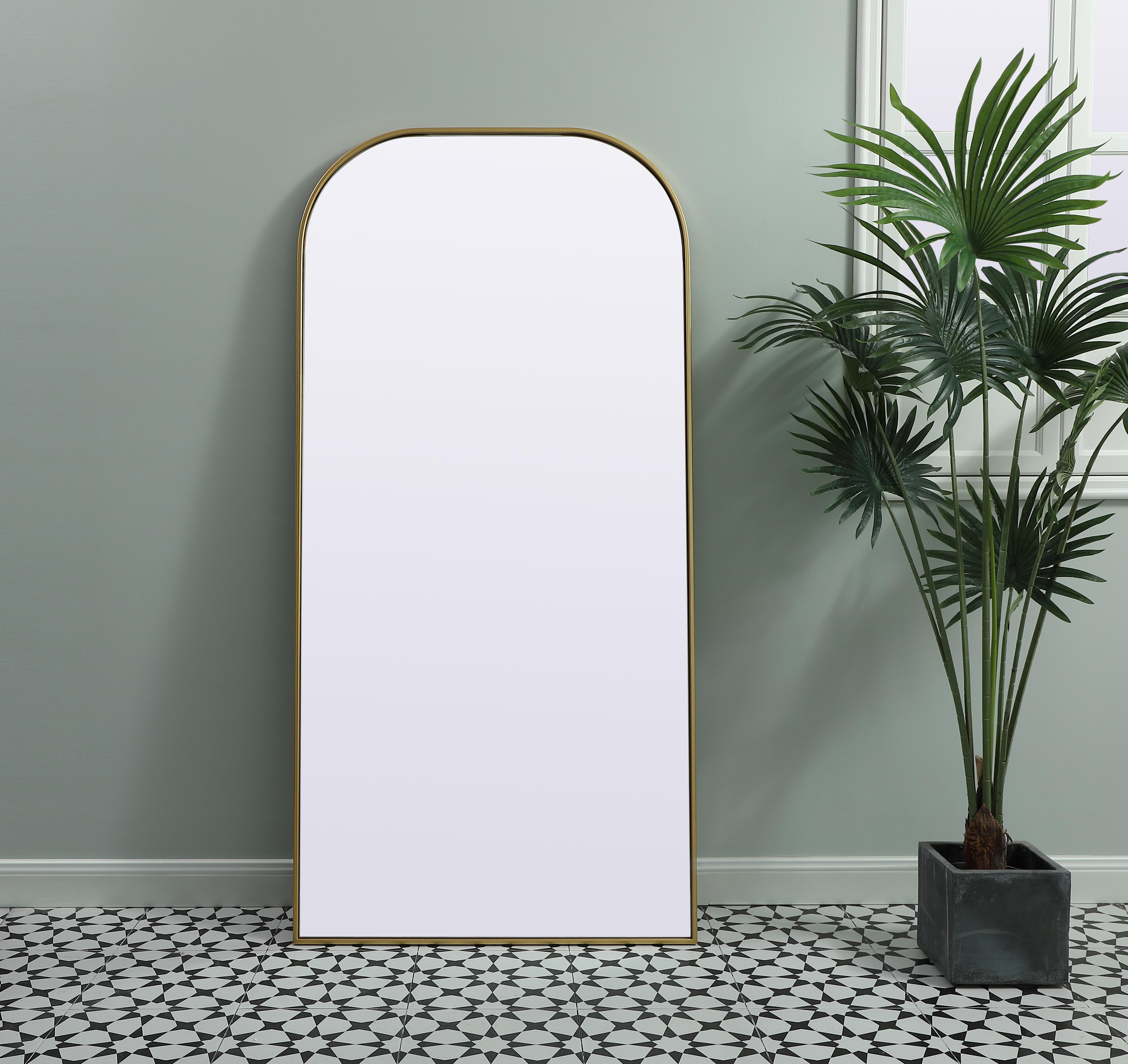 Elongated and modern, its curved profile looks great as a leaning mirror or a hanging mirror by a door. This ultra thin full-length mirror makes a practical addition to any room. Set in an iron frame, this sturdy mirror complements any room. Whether you want to create an illusion of extra space or use it as a functional accent, this mirror will make a big statement over your wall. Comes in three satin finishes in black, brass, or silver. Collection: Blaire Finish: Brass Width: 32.00" Height: 66.00" Length: 66.00" Weight: 39.00 lb Material: iron and MDF Country of Origin: China Manufacturer Warranty: 1 year limited - alternate view