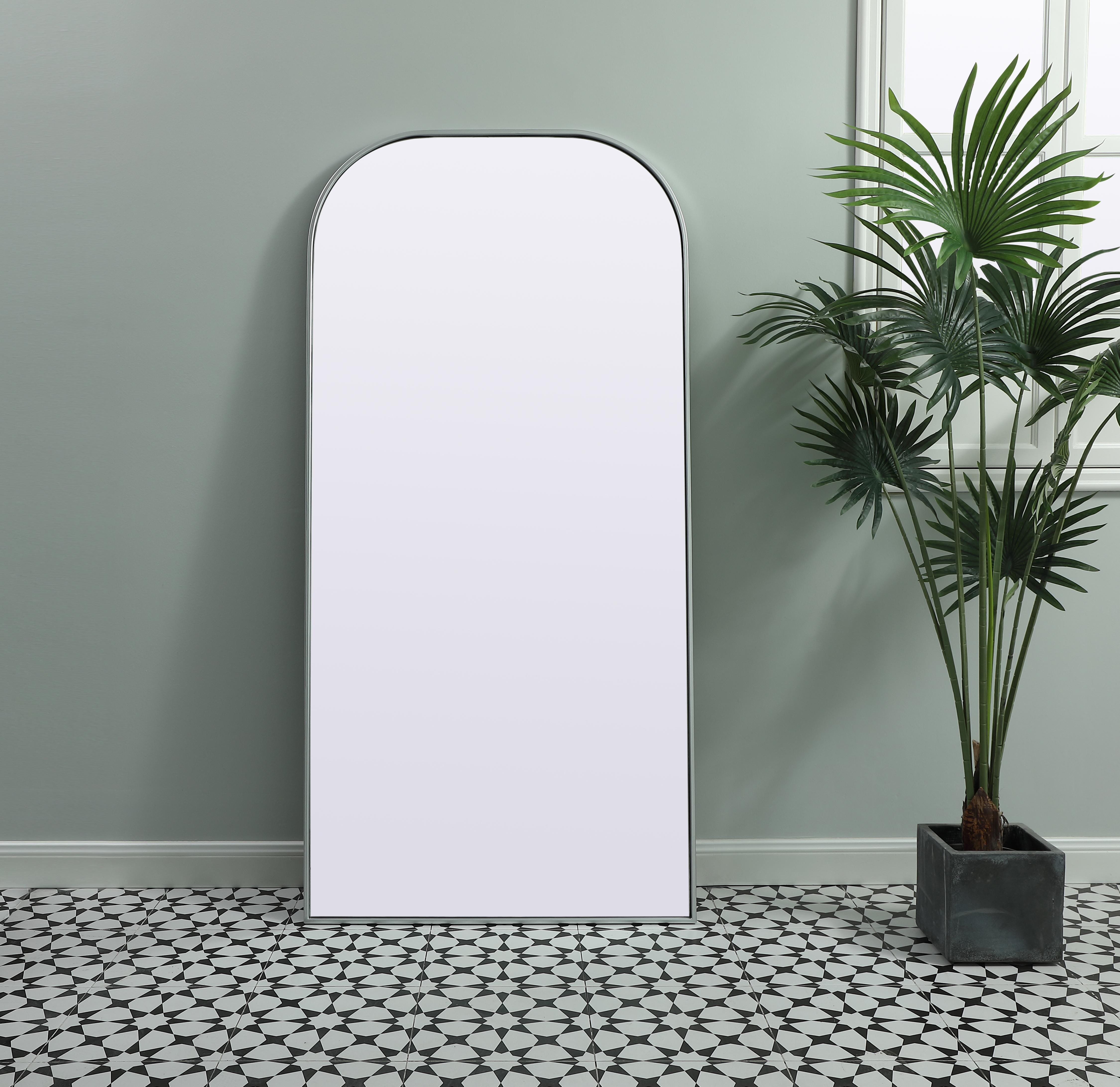 Elongated and modern, its curved profile looks great as a leaning mirror or a hanging mirror by a door. This ultra thin full-length mirror makes a practical addition to any room. Set in an iron frame, this sturdy mirror complements any room. Whether you want to create an illusion of extra space or use it as a functional accent, this mirror will make a big statement over your wall. Comes in three satin finishes in black, brass, or silver. Collection: Blaire Finish: Silver Width: 32.00" Height: 66.00" Length: 66.00" Weight: 39.00 lb Material: iron and MDF Country of Origin: China Manufacturer Warranty: 1 year limited - alternate view