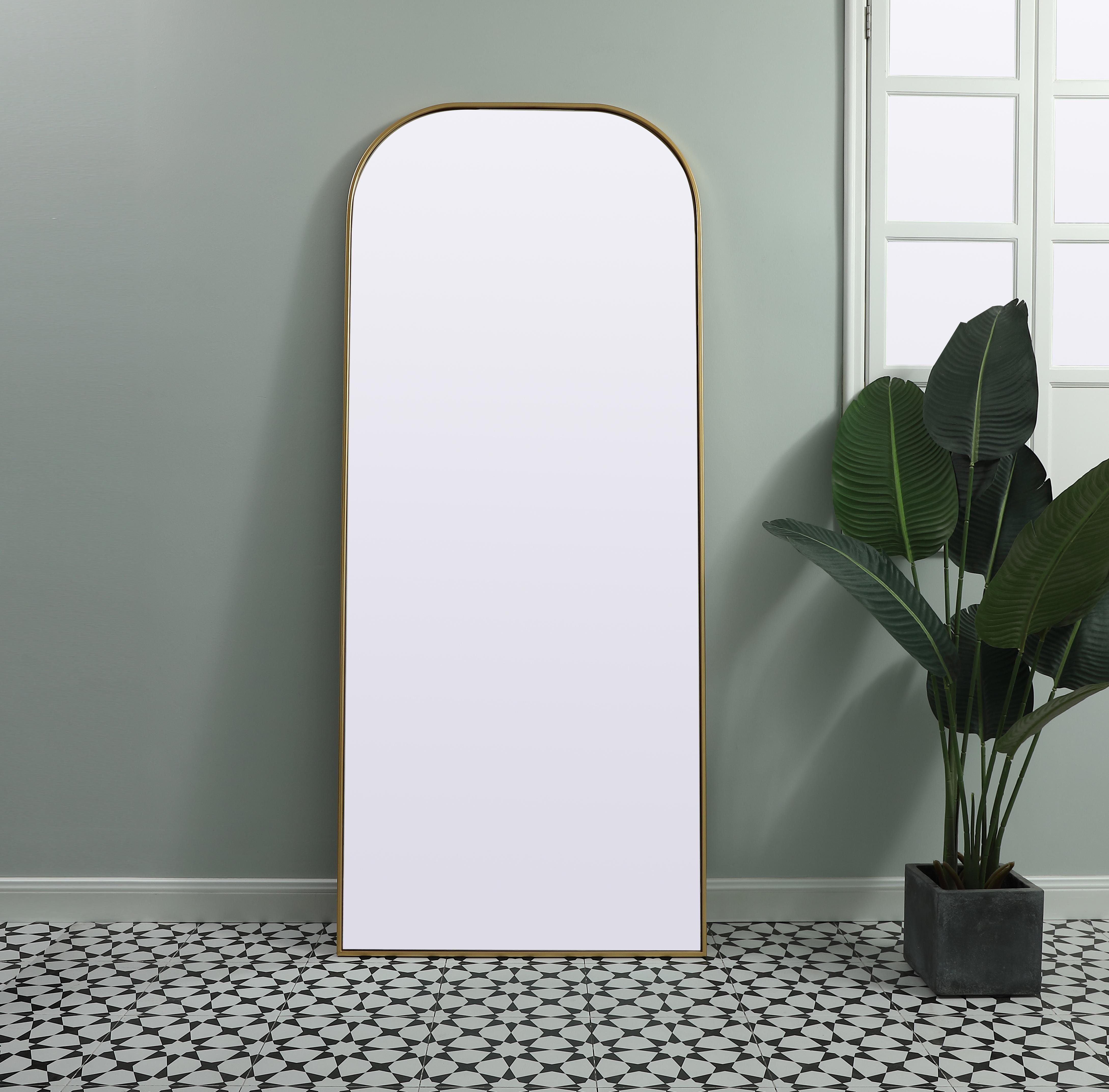 Over the mantel mirror serves an ideal décor on the mantel because it acts as an anchor piece that you can accentuate around with smaller accessories. The reflective qualities of the mirror can also make a space look bigger and brighter since it bounces light coming from your light sources. Designed with square bottom edges and rounded top, this mirror gives an unexpected twist to your typical mirror look. Select from three satin finishes in black, brass, or silver. Collection: Blaire Finish: Brass Width: 32.00" Height: 76.00" Length: 76.00" Weight: 45.00 lb Material: iron and MDF Country of Origin: China Manufacturer Warranty: 1 year limited - alternate view