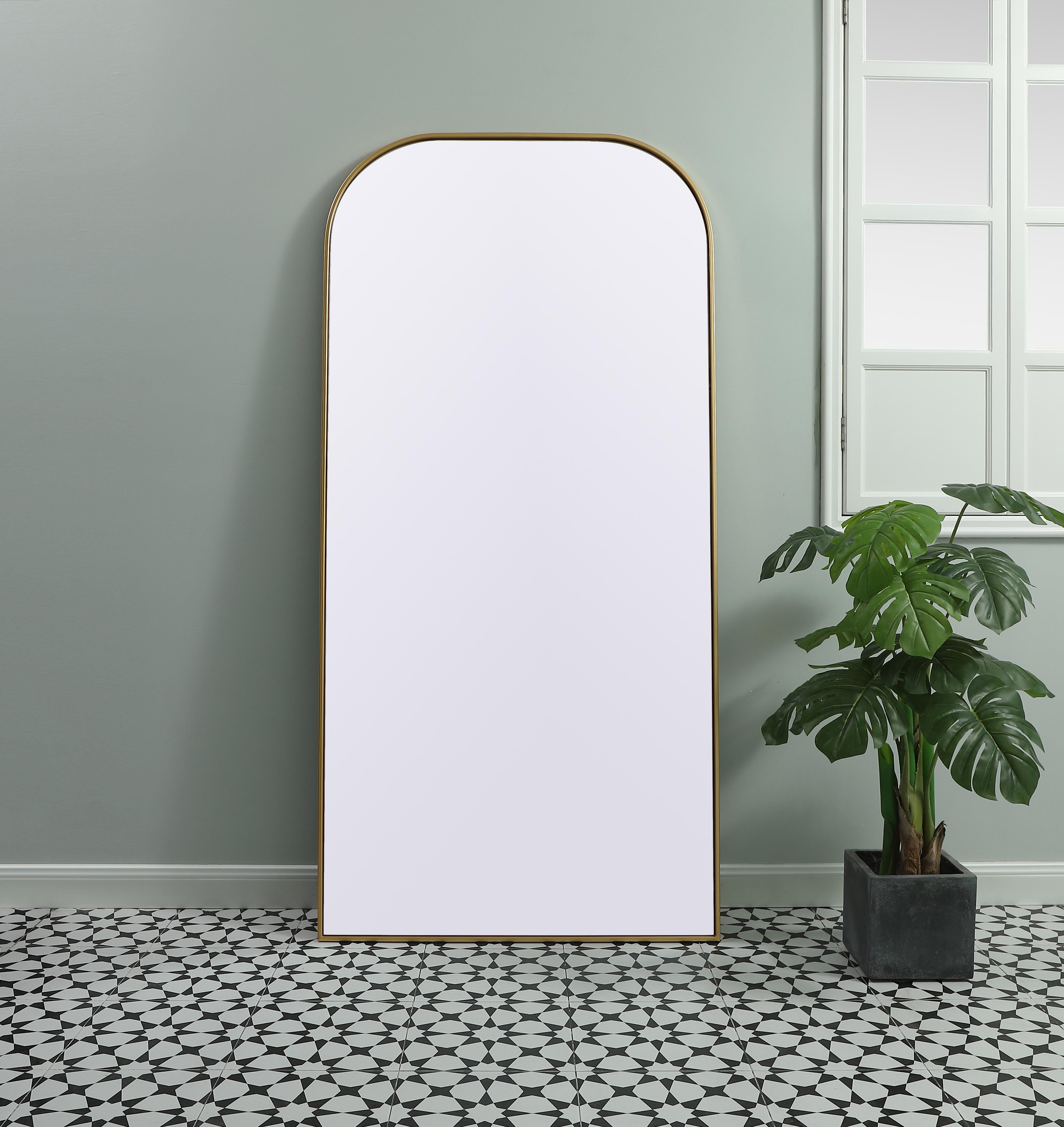 Elongated and modern, its curved profile looks great as a leaning mirror or a hanging mirror by a door. This ultra thin full-length mirror makes a practical addition to any room. Set in an iron frame, this sturdy mirror complements any room. Whether you want to create an illusion of extra space or use it as a functional accent, this mirror will make a big statement over your wall. Comes in three satin finishes in black, brass, or silver. Collection: Blaire Finish: Brass Width: 35.00" Height: 72.00" Length: 72.00" Weight: 45.00 lb Material: iron and MDF Country of Origin: China Manufacturer Warranty: 1 year limited - alternate view