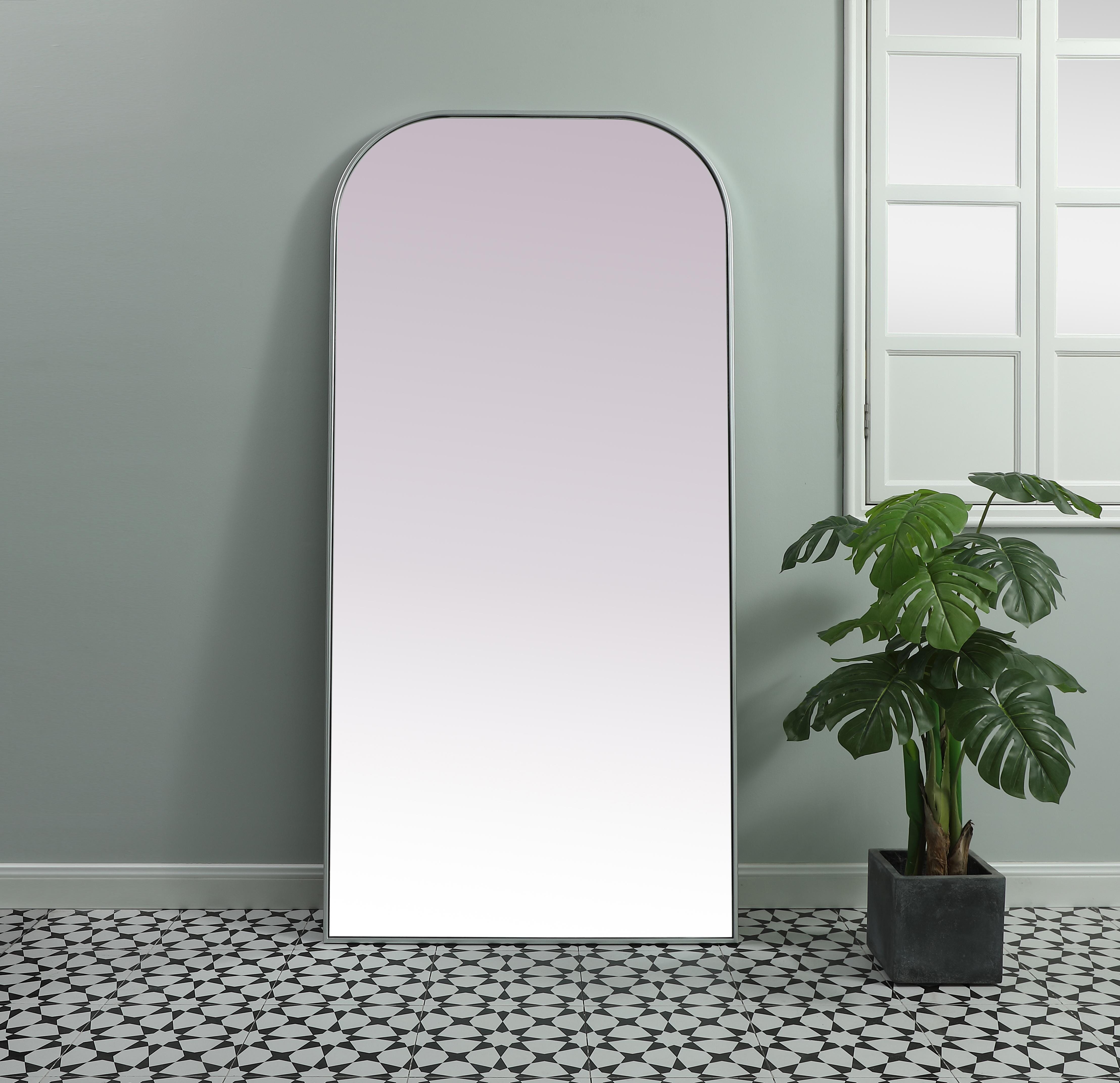 Elongated and modern, its curved profile looks great as a leaning mirror or a hanging mirror by a door. This ultra thin full-length mirror makes a practical addition to any room. Set in an iron frame, this sturdy mirror complements any room. Whether you want to create an illusion of extra space or use it as a functional accent, this mirror will make a big statement over your wall. Comes in three satin finishes in black, brass, or silver. Collection: Blaire Finish: Silver Width: 35.00" Height: 72.00" Length: 72.00" Weight: 45.00 lb Material: iron and MDF Country of Origin: China Manufacturer Warranty: 1 year limited - alternate view