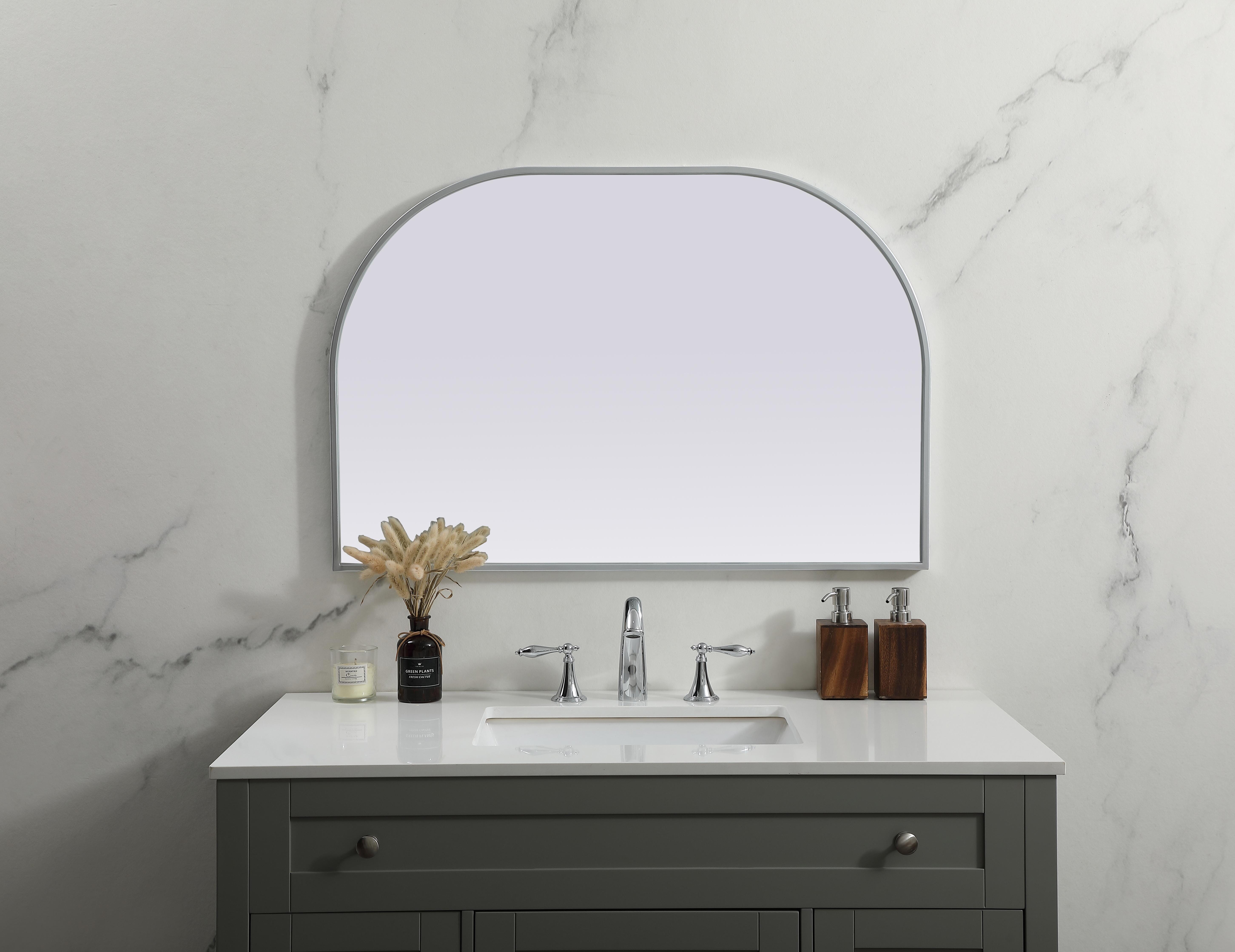 Over the mantel mirror serves an ideal décor on the mantel because it acts as an anchor piece that you can accentuate around with smaller accessories. The reflective qualities of the mirror can also make a space look bigger and brighter since it bounces light coming from your light sources. Designed with square bottom edges and rounded top, this mirror gives an unexpected twist to your typical mirror look. Select from three satin finishes in black, brass, or silver. Collection: Blaire Finish: Silver Width: 36.00" Height: 24.00" Length: 24.00" Weight: 16.00 lb Material: iron and MDF Country of Origin: China Manufacturer Warranty: 1 year limited - alternate view