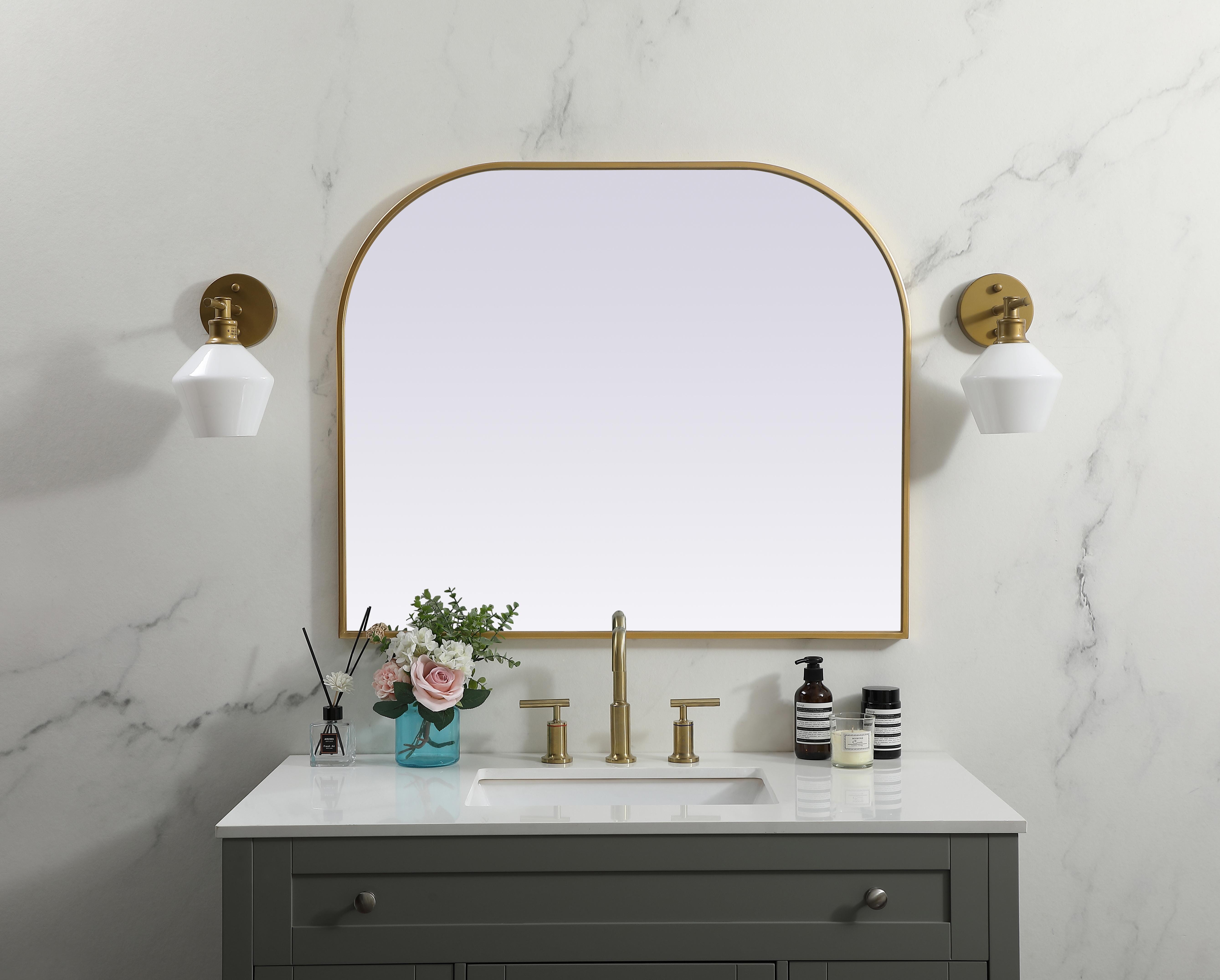 Over the mantel mirror serves an ideal décor on the mantel because it acts as an anchor piece that you can accentuate around with smaller accessories. The reflective qualities of the mirror can also make a space look bigger and brighter since it bounces light coming from your light sources. Designed with square bottom edges and rounded top, this mirror gives an unexpected twist to your typical mirror look. Select from three satin finishes in black, brass, or silver. Collection: Blaire Finish: Brass Width: 36.00" Height: 30.00" Length: 30.00" Weight: 20.00 lb Material: iron and MDF Country of Origin: China Manufacturer Warranty: 1 year limited - alternate view