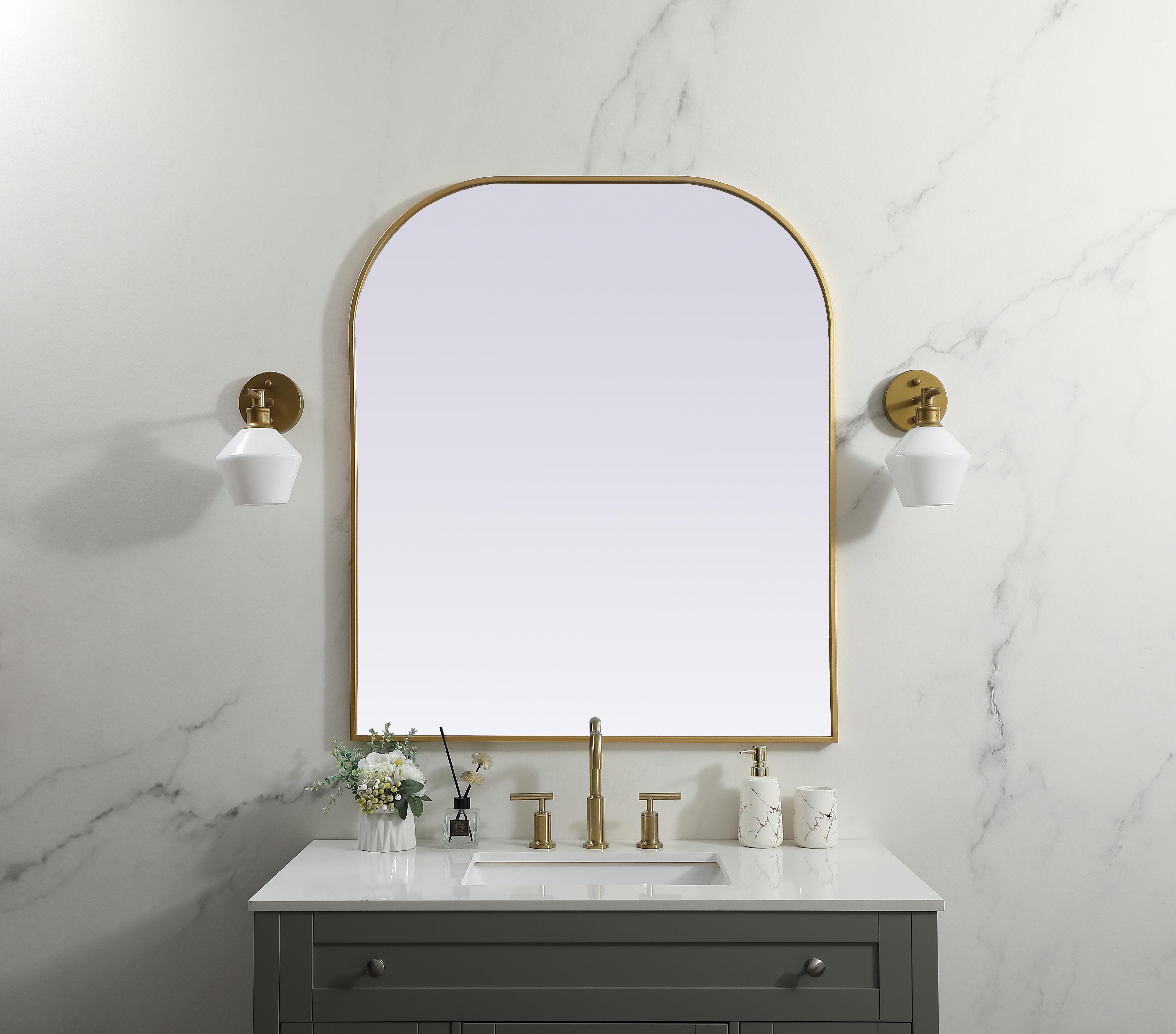 Over the mantel mirror serves an ideal décor on the mantel because it acts as an anchor piece that you can accentuate around with smaller accessories. The reflective qualities of the mirror can also make a space look bigger and brighter since it bounces light coming from your light sources. Designed with square bottom edges and rounded top, this mirror gives an unexpected twist to your typical mirror look. Select from three satin finishes in black, brass, or silver. Collection: Blaire Finish: Brass Width: 36.00" Height: 42.00" Length: 42.00" Weight: 27.00 lb Material: iron and MDF Country of Origin: China Manufacturer Warranty: 1 year limited - alternate view