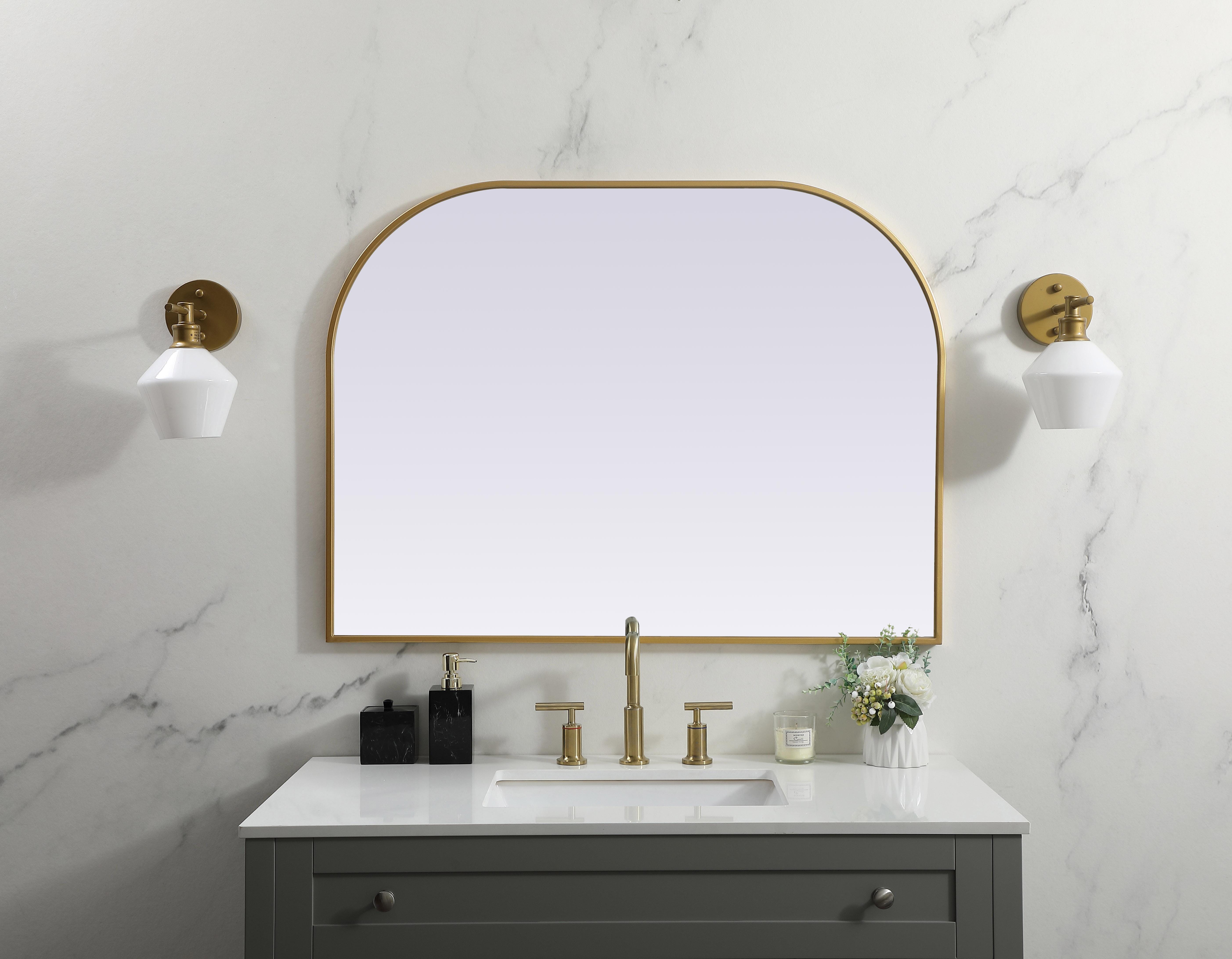 Over the mantel mirror serves an ideal décor on the mantel because it acts as an anchor piece that you can accentuate around with smaller accessories. The reflective qualities of the mirror can also make a space look bigger and brighter since it bounces light coming from your light sources. Designed with square bottom edges and rounded top, this mirror gives an unexpected twist to your typical mirror look. Select from three satin finishes in black, brass, or silver. Collection: Blaire Finish: Brass Width: 40.00" Height: 30.00" Length: 30.00" Weight: 22.00 lb Material: iron and MDF Country of Origin: China Manufacturer Warranty: 1 year limited - alternate view