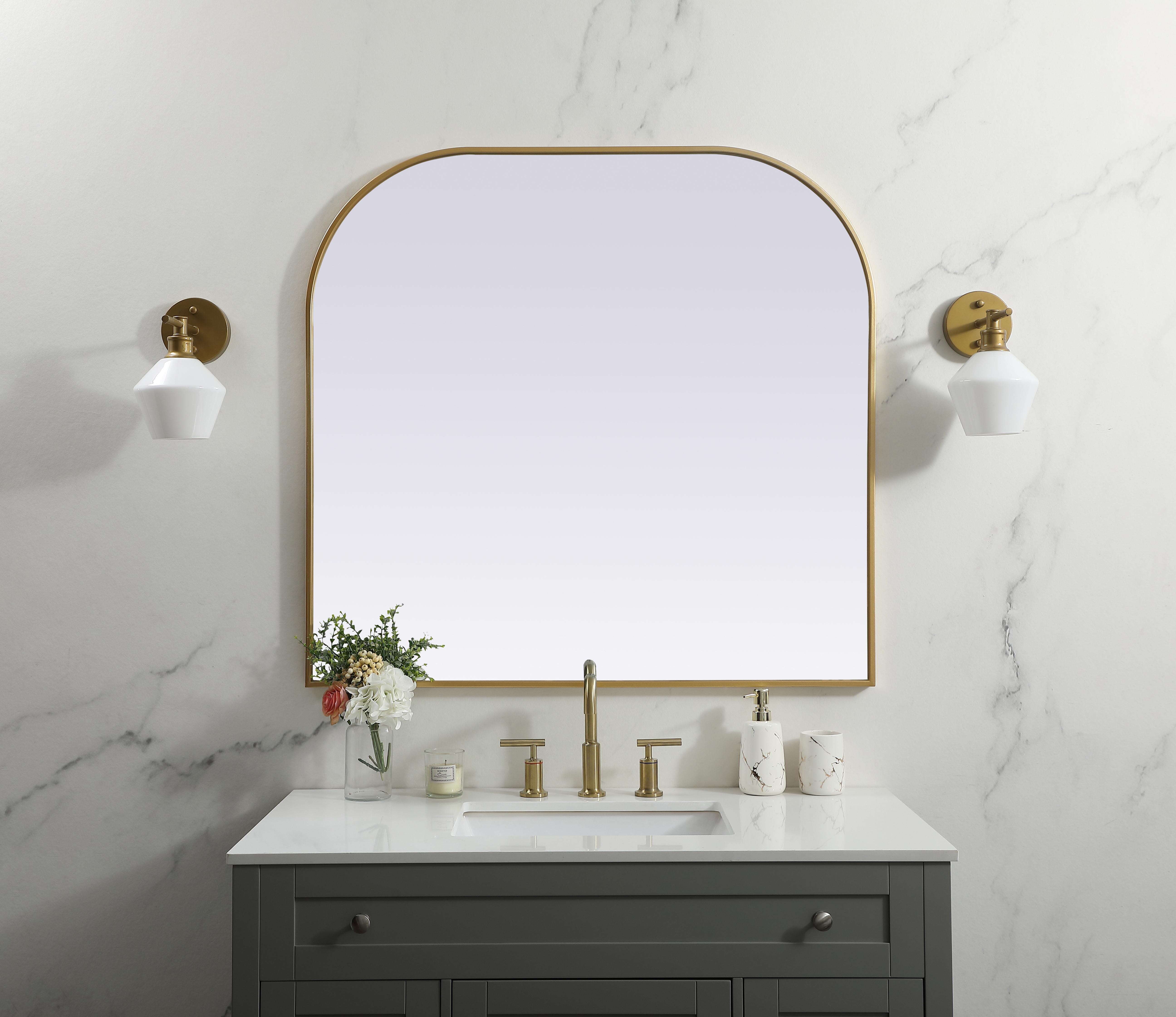 Over the mantel mirror serves an ideal décor on the mantel because it acts as an anchor piece that you can accentuate around with smaller accessories. The reflective qualities of the mirror can also make a space look bigger and brighter since it bounces light coming from your light sources. Designed with square bottom edges and rounded top, this mirror gives an unexpected twist to your typical mirror look. Select from three satin finishes in black, brass, or silver. Collection: Blaire Finish: Brass Width: 40.00" Height: 38.00" Length: 38.00" Weight: 27.00 lb Material: iron and MDF Country of Origin: China Manufacturer Warranty: 1 year limited - alternate view
