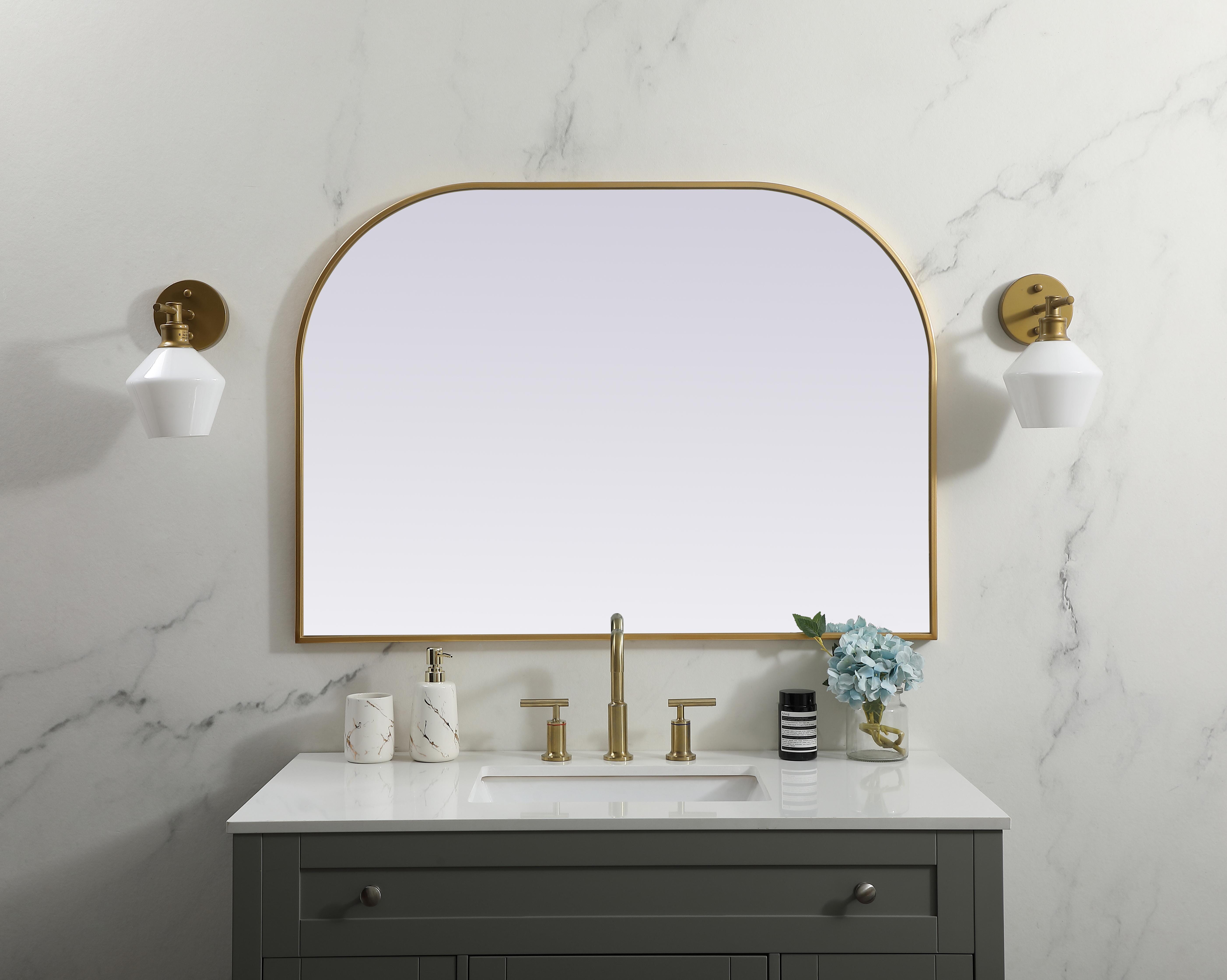 Over the mantel mirror serves an ideal décor on the mantel because it acts as an anchor piece that you can accentuate around with smaller accessories. The reflective qualities of the mirror can also make a space look bigger and brighter since it bounces light coming from your light sources. Designed with square bottom edges and rounded top, this mirror gives an unexpected twist to your typical mirror look. Select from three satin finishes in black, brass, or silver. Collection: Blaire Finish: Brass Width: 42.00" Height: 30.00" Length: 30.00" Weight: 22.00 lb Material: iron and MDF Country of Origin: China Manufacturer Warranty: 1 year limited - alternate view