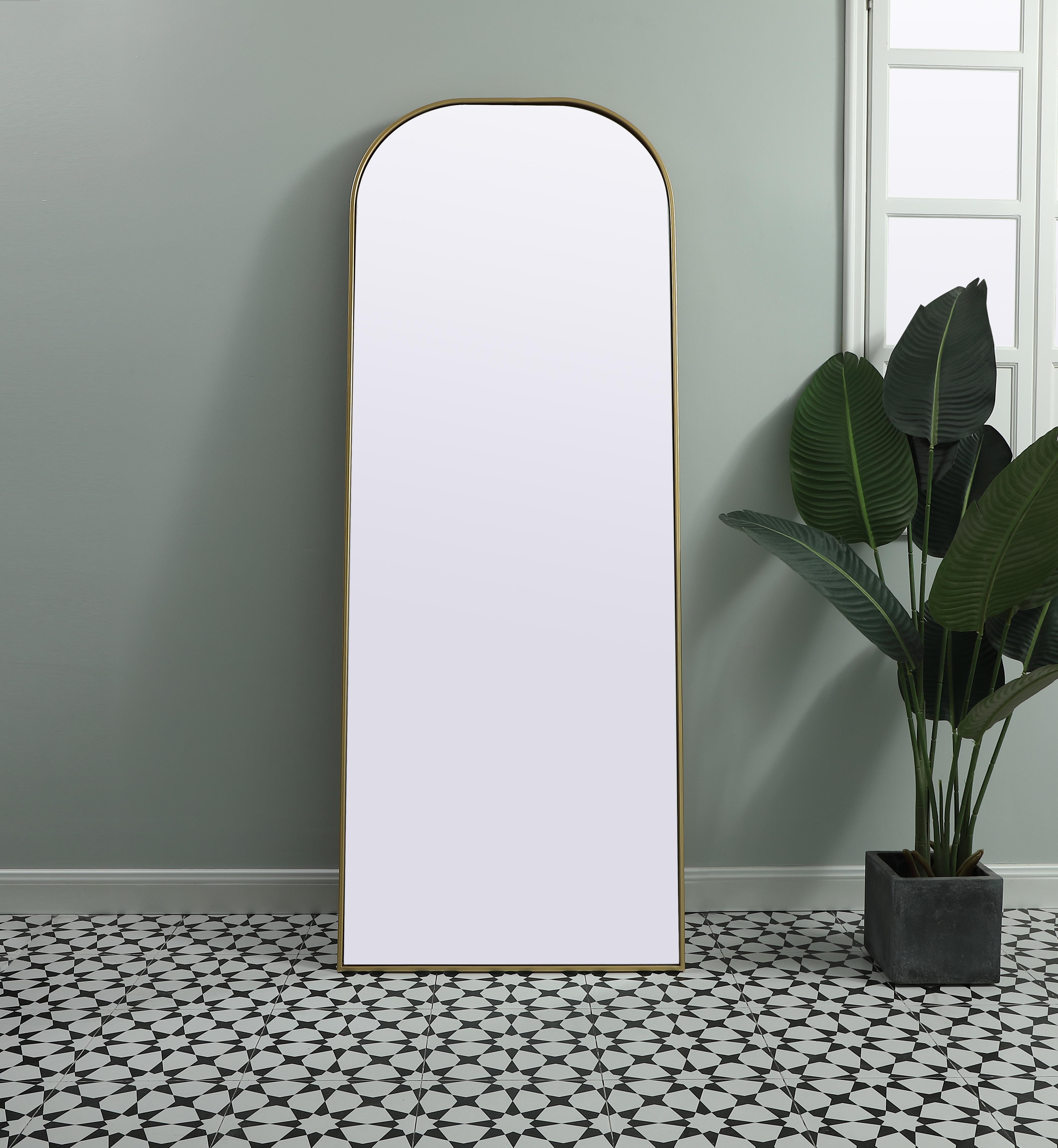 Add a rounded-top full length mirror to your home decor to elevate it to the next level. A full-length mirror is the perfect wall decor choice for any room or living space. This accessory is perfect for adoring full outfits in the full length of your body or providing a full view of yourself in any room, perfect for dressing areas and even bathrooms. Not only does this full-length iron frame large wall mirror provide practical uses, but it also acts as a beautiful addition to any home decor with its sleek, modern design. The mirror can be leaned to the wall, free-standing, or can be installed vertically or horizontally on the wall. Available in three satin finishes: black, brass, and silver. Collection: Blaire Finish: Brass Width: 28.00" Height: 74.00" Length: 74.00" Weight: 40.00 lb Material: iron and MDF Country of Origin: China Manufacturer Warranty: 1 year limited - alternate view