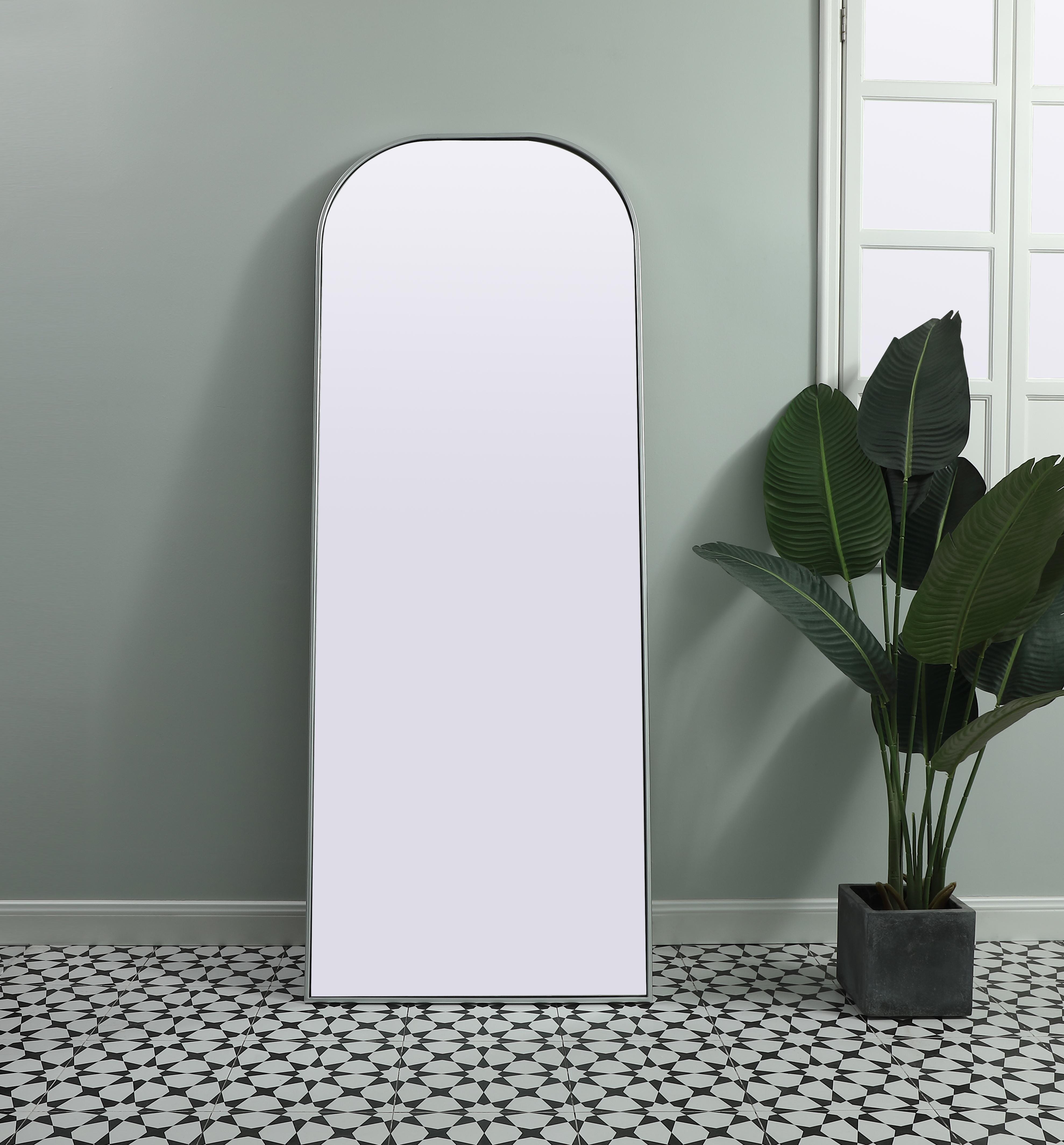 Add a rounded-top full length mirror to your home decor to elevate it to the next level. A full-length mirror is the perfect wall decor choice for any room or living space. This accessory is perfect for adoring full outfits in the full length of your body or providing a full view of yourself in any room, perfect for dressing areas and even bathrooms. Not only does this full-length iron frame large wall mirror provide practical uses, but it also acts as a beautiful addition to any home decor with its sleek, modern design. The mirror can be leaned to the wall, free-standing, or can be installed vertically or horizontally on the wall. Available in three satin finishes: black, brass, and silver. Collection: Blaire Finish: Silver Width: 28.00" Height: 74.00" Length: 74.00" Weight: 40.00 lb Material: iron and MDF Country of Origin: China Manufacturer Warranty: 1 year limited - alternate view