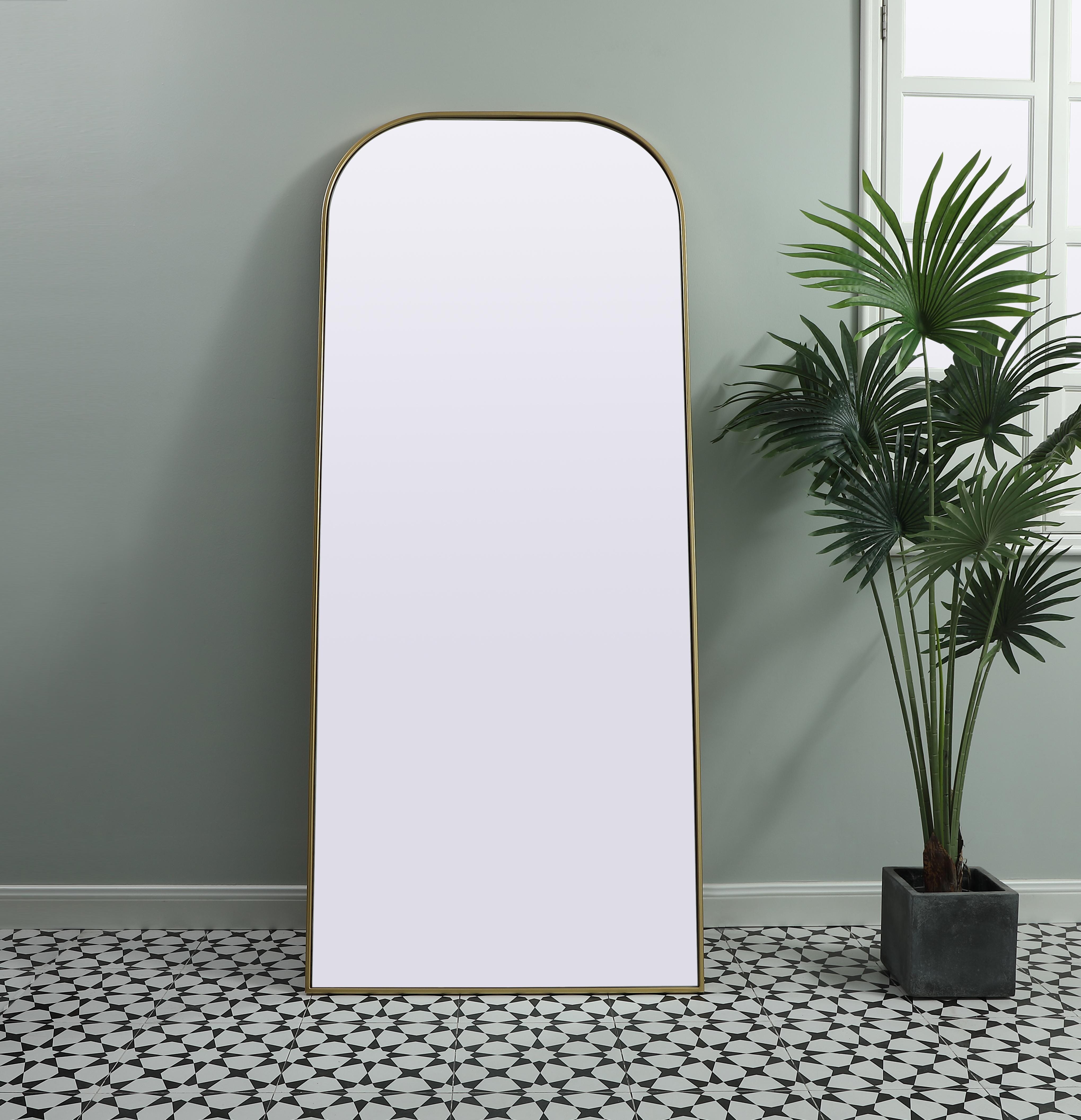 Add a rounded-top full length mirror to your home decor to elevate it to the next level. A full-length mirror is the perfect wall decor choice for any room or living space. This accessory is perfect for adoring full outfits in the full length of your body or providing a full view of yourself in any room, perfect for dressing areas and even bathrooms. Not only does this full-length iron frame large wall mirror provide practical uses, but it also acts as a beautiful addition to any home decor with its sleek, modern design. The mirror can be leaned to the wall, free-standing, or can be installed vertically or horizontally on the wall. Available in three satin finishes: black, brass, and silver. Collection: Blaire Finish: Brass Width: 32.00" Height: 76.00" Length: 76.00" Weight: 48.00 lb Material: iron and MDF Country of Origin: China Manufacturer Warranty: 1 year limited - alternate view