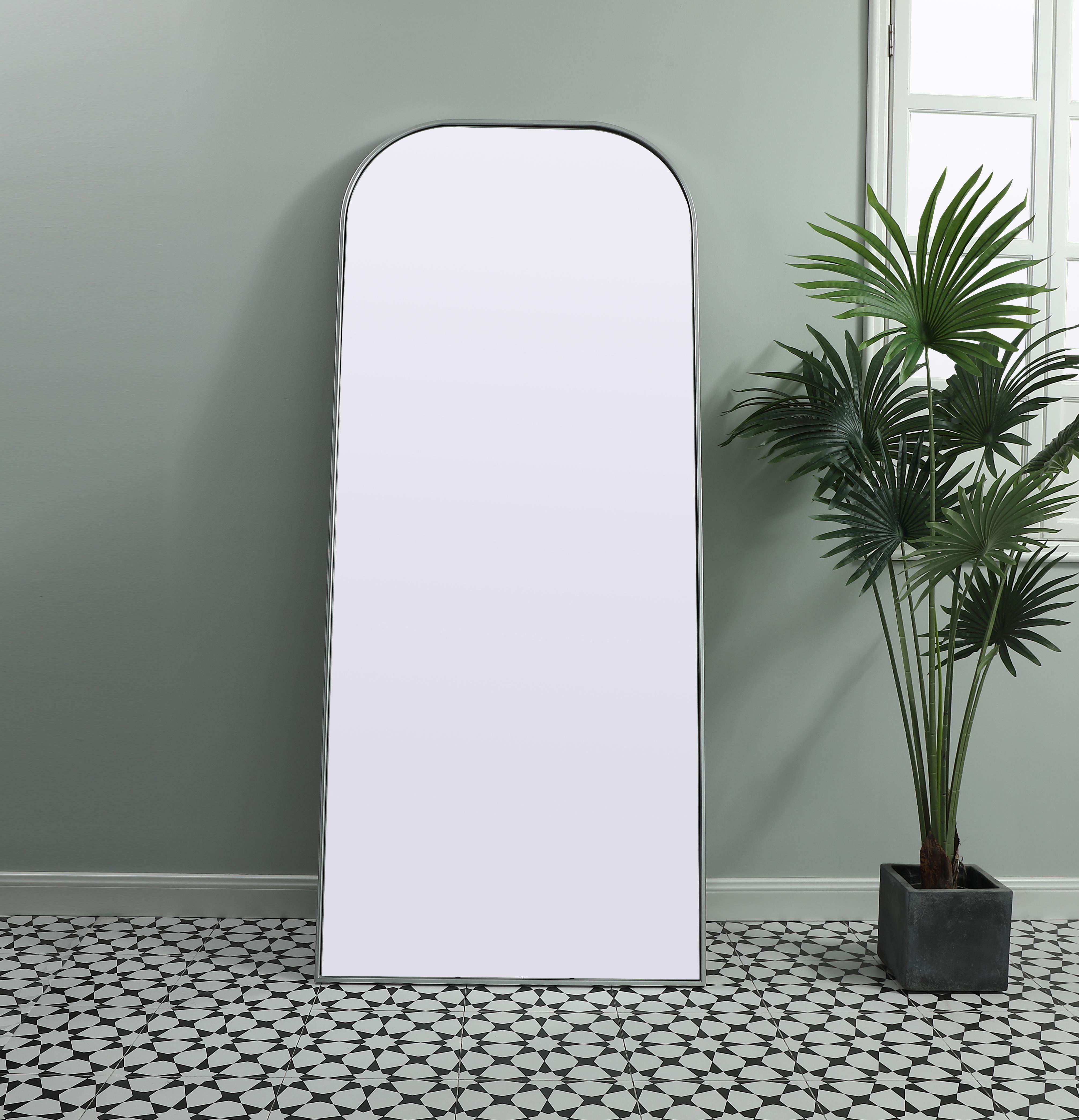 Add a rounded-top full length mirror to your home decor to elevate it to the next level. A full-length mirror is the perfect wall decor choice for any room or living space. This accessory is perfect for adoring full outfits in the full length of your body or providing a full view of yourself in any room, perfect for dressing areas and even bathrooms. Not only does this full-length iron frame large wall mirror provide practical uses, but it also acts as a beautiful addition to any home decor with its sleek, modern design. The mirror can be leaned to the wall, free-standing, or can be installed vertically or horizontally on the wall. Available in three satin finishes: black, brass, and silver. Collection: Blaire Finish: Silver Width: 32.00" Height: 76.00" Length: 76.00" Weight: 48.00 lb Material: iron and MDF Country of Origin: China Manufacturer Warranty: 1 year limited - alternate view