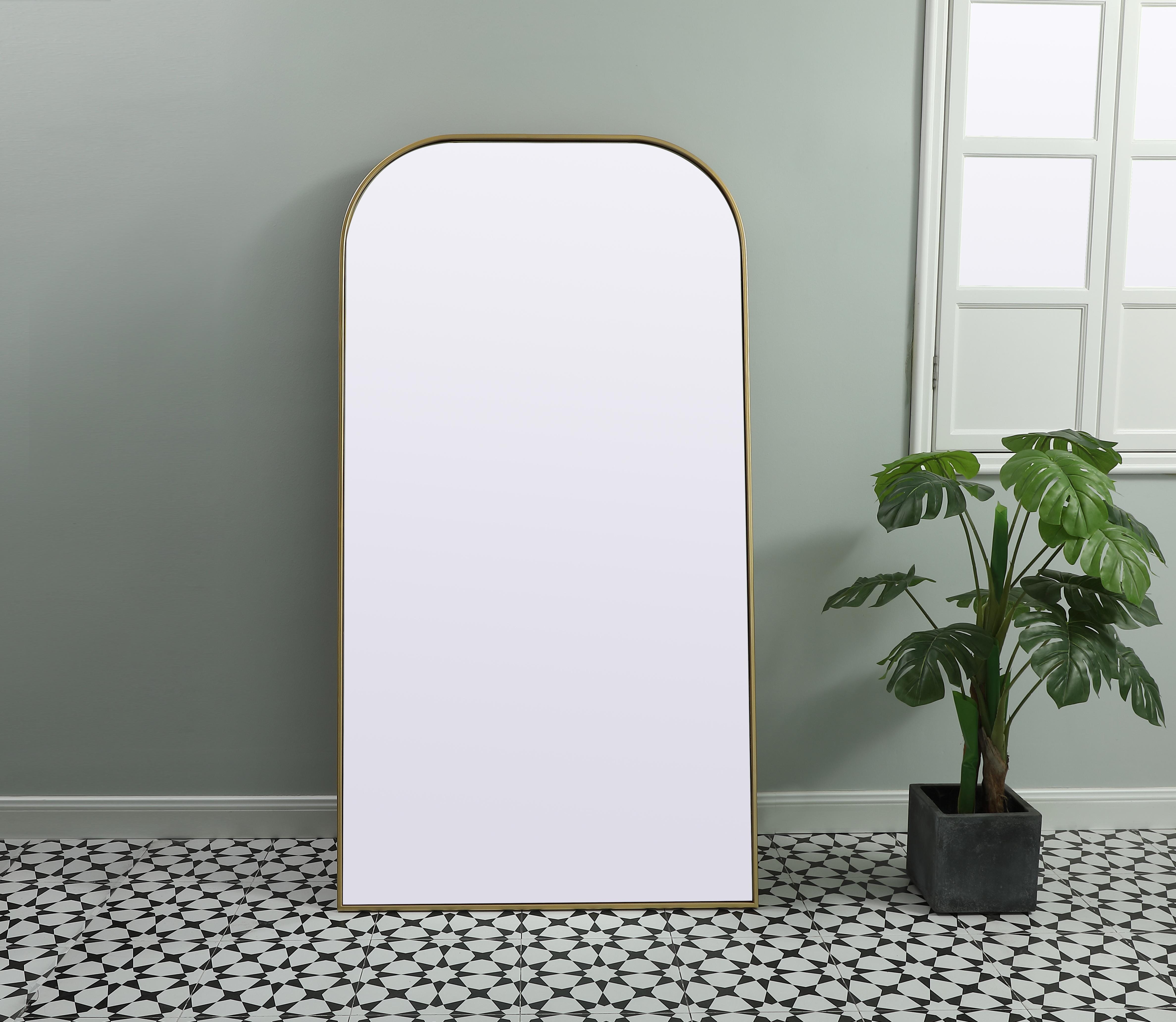 Add a rounded-top full length mirror to your home decor to elevate it to the next level. A full-length mirror is the perfect wall decor choice for any room or living space. This accessory is perfect for adoring full outfits in the full length of your body or providing a full view of yourself in any room, perfect for dressing areas and even bathrooms. Not only does this full-length iron frame large wall mirror provide practical uses, but it also acts as a beautiful addition to any home decor with its sleek, modern design. The mirror can be leaned to the wall, free-standing, or can be installed vertically or horizontally on the wall. Available in three satin finishes: black, brass, and silver. Collection: Blaire Finish: Brass Width: 35.00" Height: 66.00" Length: 66.00" Weight: 44.00 lb Material: iron and MDF Country of Origin: China Manufacturer Warranty: 1 year limited - alternate view