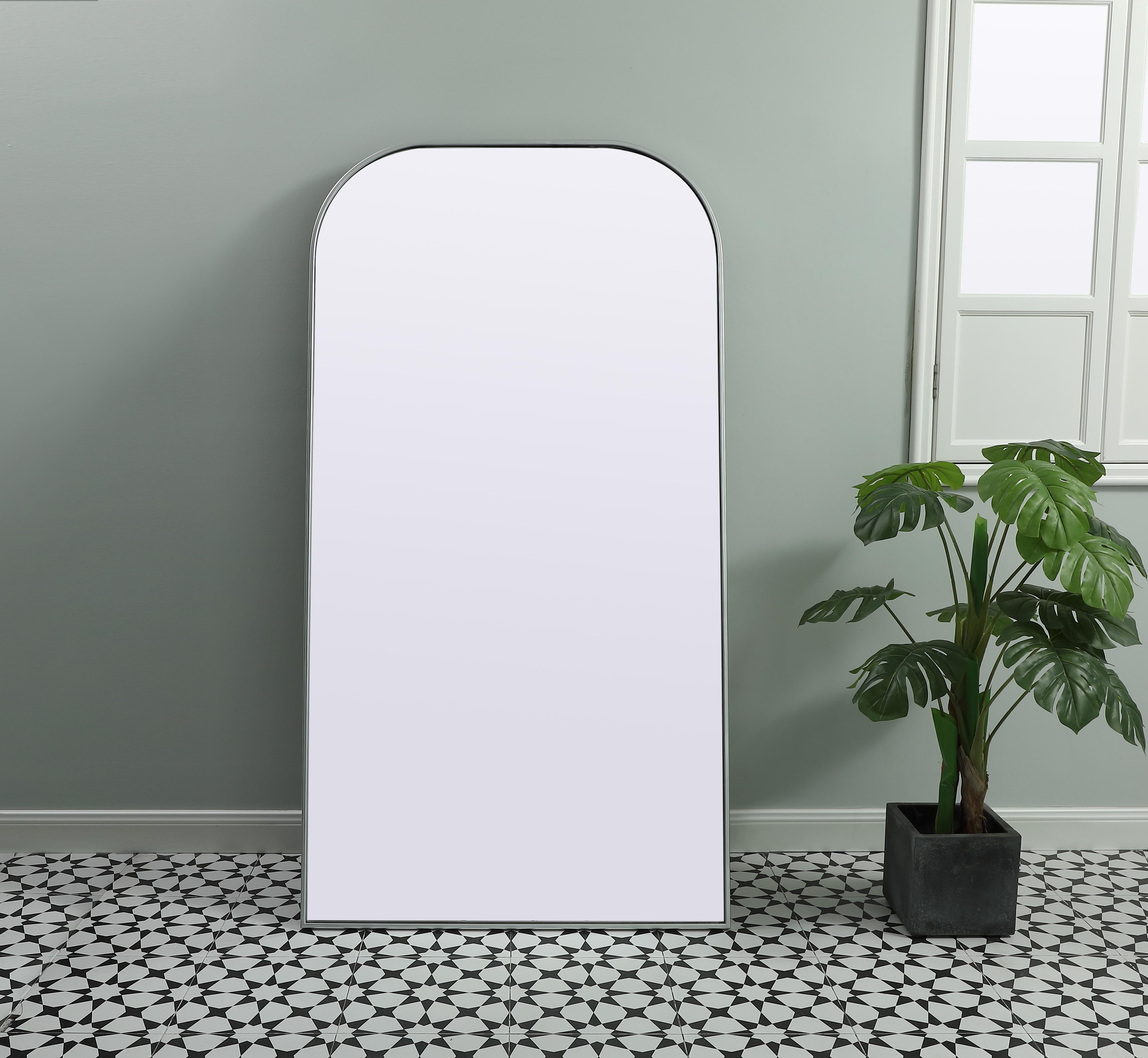 Add a rounded-top full length mirror to your home decor to elevate it to the next level. A full-length mirror is the perfect wall decor choice for any room or living space. This accessory is perfect for adoring full outfits in the full length of your body or providing a full view of yourself in any room, perfect for dressing areas and even bathrooms. Not only does this full-length iron frame large wall mirror provide practical uses, but it also acts as a beautiful addition to any home decor with its sleek, modern design. The mirror can be leaned to the wall, free-standing, or can be installed vertically or horizontally on the wall. Available in three satin finishes: black, brass, and silver. Collection: Blaire Finish: Silver Width: 35.00" Height: 66.00" Length: 66.00" Weight: 44.00 lb Material: iron and MDF Country of Origin: China Manufacturer Warranty: 1 year limited - alternate view