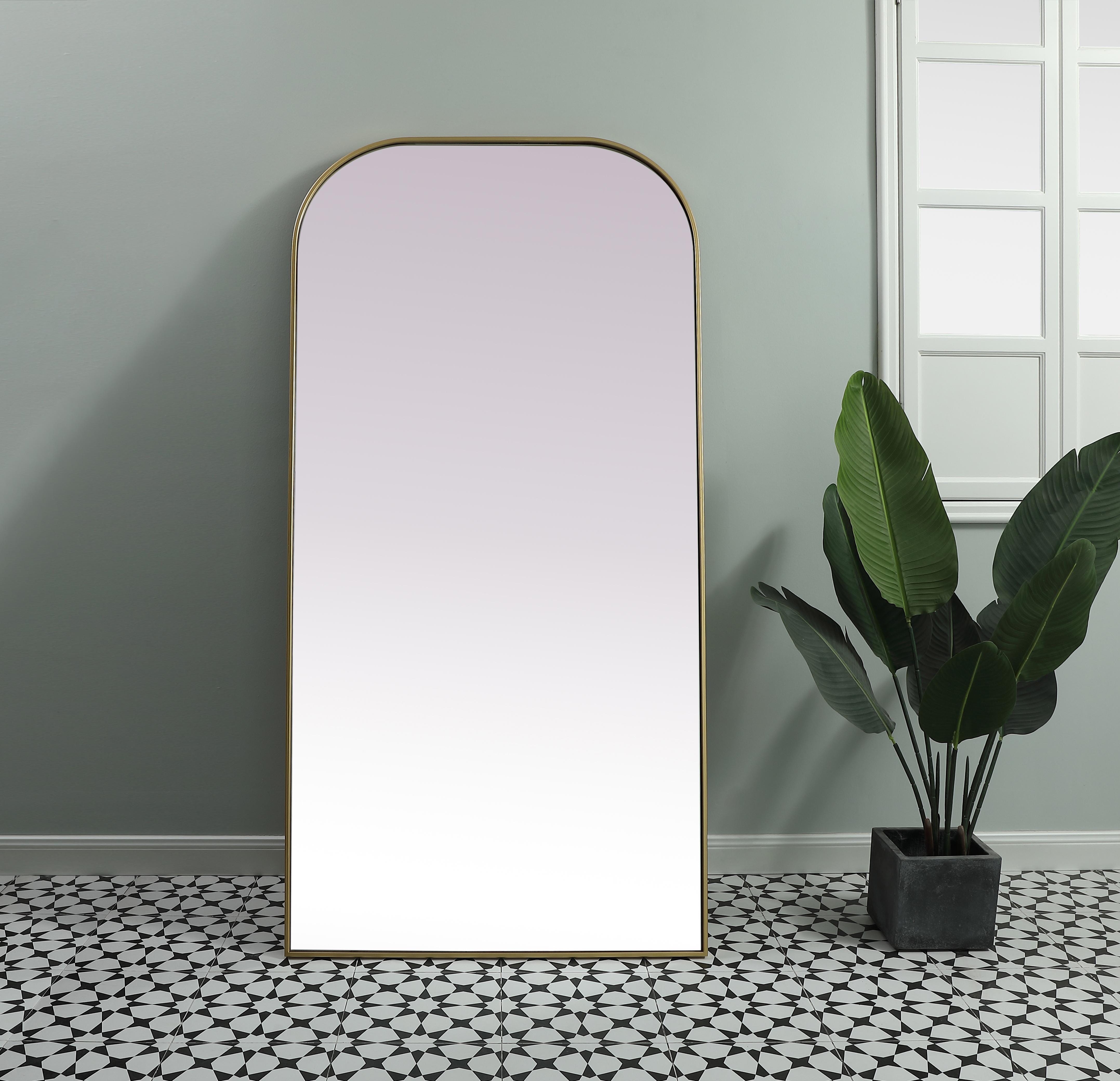 Add a rounded-top full length mirror to your home decor to elevate it to the next level. A full-length mirror is the perfect wall decor choice for any room or living space. This accessory is perfect for adoring full outfits in the full length of your body or providing a full view of yourself in any room, perfect for dressing areas and even bathrooms. Not only does this full-length iron frame large wall mirror provide practical uses, but it also acts as a beautiful addition to any home decor with its sleek, modern design. The mirror can be leaned to the wall, free-standing, or can be installed vertically or horizontally on the wall. Available in three satin finishes: black, brass, and silver. Collection: Blaire Finish: Brass Width: 35.00" Height: 72.00" Length: 72.00" Weight: 51.00 lb Material: iron and MDF Country of Origin: China Manufacturer Warranty: 1 year limited - alternate view