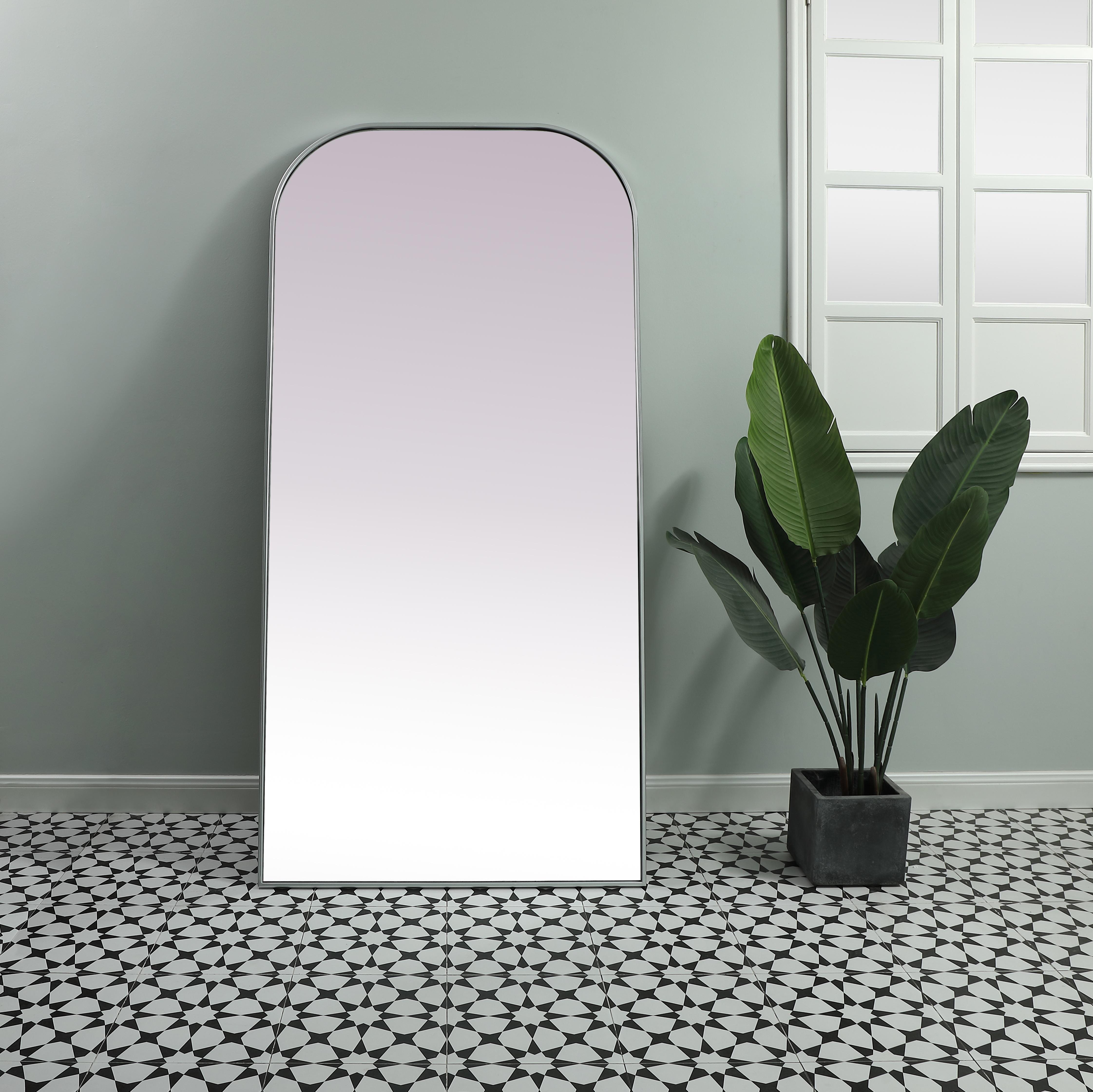 Add a rounded-top full length mirror to your home decor to elevate it to the next level. A full-length mirror is the perfect wall decor choice for any room or living space. This accessory is perfect for adoring full outfits in the full length of your body or providing a full view of yourself in any room, perfect for dressing areas and even bathrooms. Not only does this full-length iron frame large wall mirror provide practical uses, but it also acts as a beautiful addition to any home decor with its sleek, modern design. The mirror can be leaned to the wall, free-standing, or can be installed vertically or horizontally on the wall. Available in three satin finishes: black, brass, and silver. Collection: Blaire Finish: Silver Width: 35.00" Height: 72.00" Length: 72.00" Weight: 51.00 lb Material: iron and MDF Country of Origin: China Manufacturer Warranty: 1 year limited - alternate view