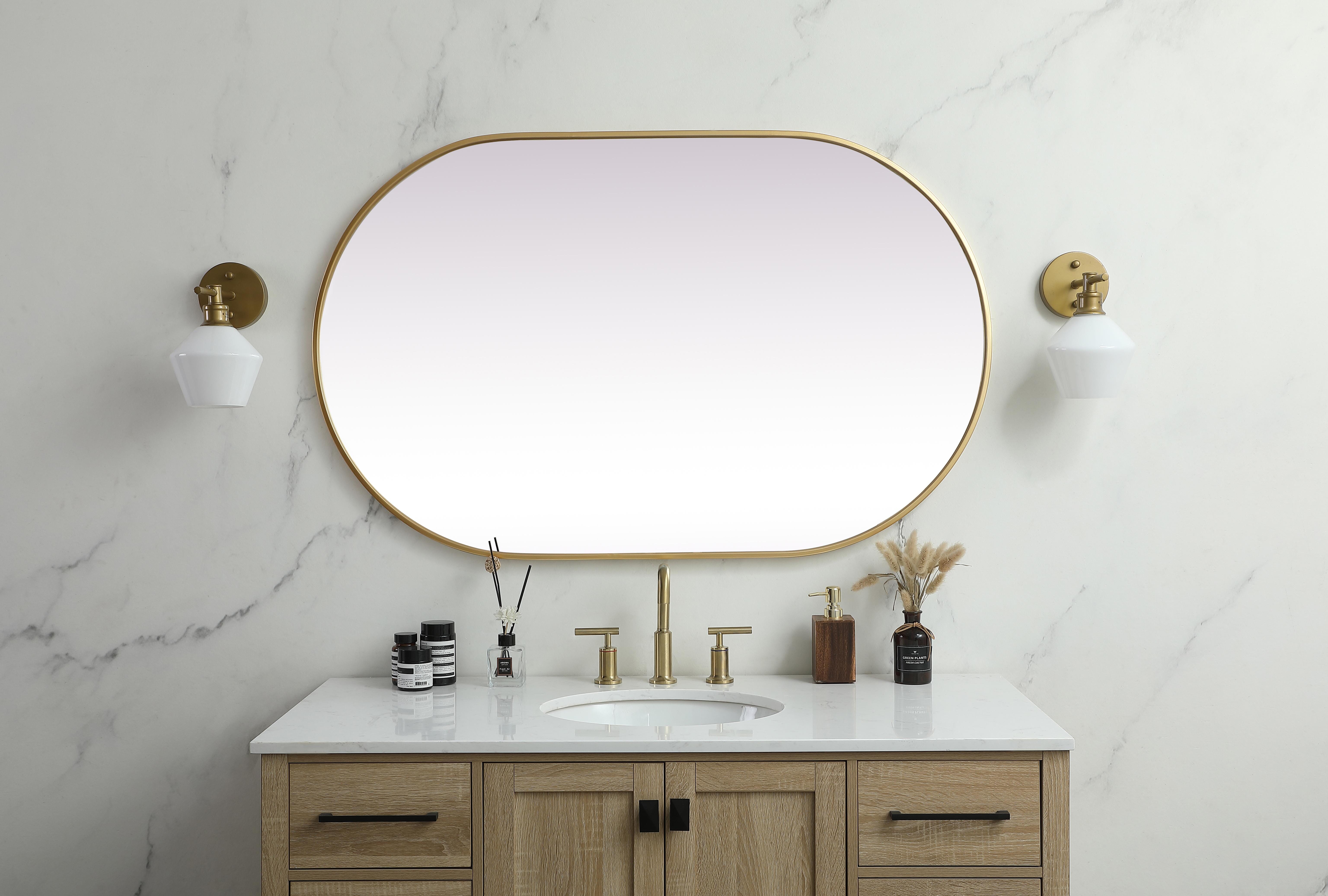 Instantly open up any space in your home with this minimalist wall-mounted mirror. Crafted of metal, this mirror strikes a pill-shaped silhouette. Its slender, clean-lined frame sports a classic finish, while the glass mirror within features a flat, for a brilliant reflection, letting the light bounce off to expand your space. Designed in a pill shape, this metal-frame mirror showcases in the three available satin finishes in black, brass, or silver. Mount this work of art in any room of your choice for added visual impact. Collection: Asha Rooms: living room, entryway, bathroom, office Finish: Brass Width: 1.00" Height: 48.00" Length: 30.00" Weight: 25.00 lb Material: iron and MDF Country of Origin: China Manufacturer Warranty: 1 year limited - alternate view