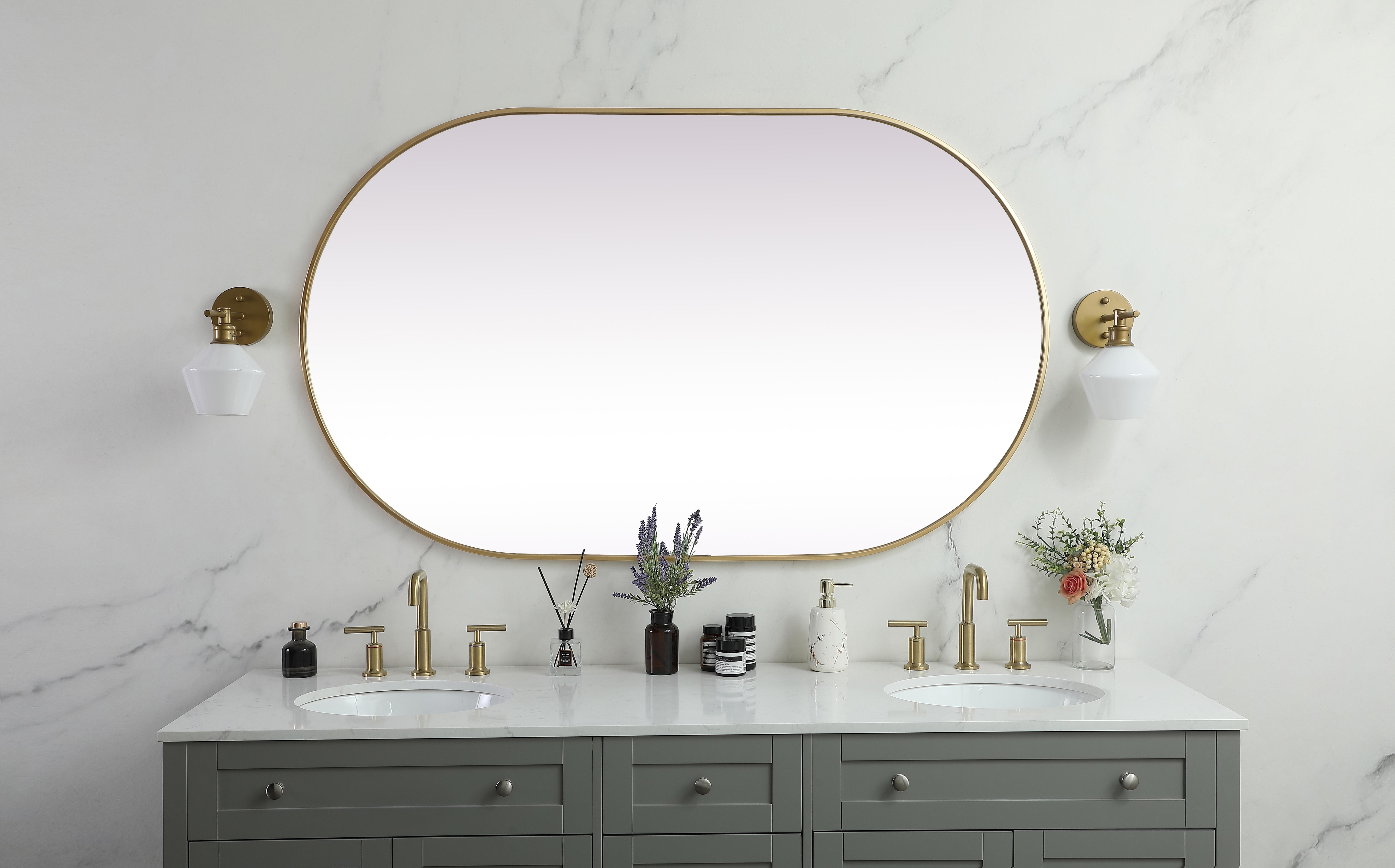 Instantly open up any space in your home with this minimalist wall-mounted mirror. Crafted of metal, this mirror strikes a pill-shaped silhouette. Its slender, clean-lined frame sports a classic finish, while the glass mirror within features a flat, for a brilliant reflection, letting the light bounce off to expand your space. Designed in a pill shape, this metal-frame mirror showcases in the three available satin finishes in black, brass, or silver. Mount this work of art in any room of your choice for added visual impact. Collection: Asha Rooms: living room, entryway, bathroom, office Finish: Brass Width: 1.00" Height: 60.00" Length: 36.00" Weight: 36.00 lb Material: iron and MDF Country of Origin: China Manufacturer Warranty: 1 year limited - alternate view