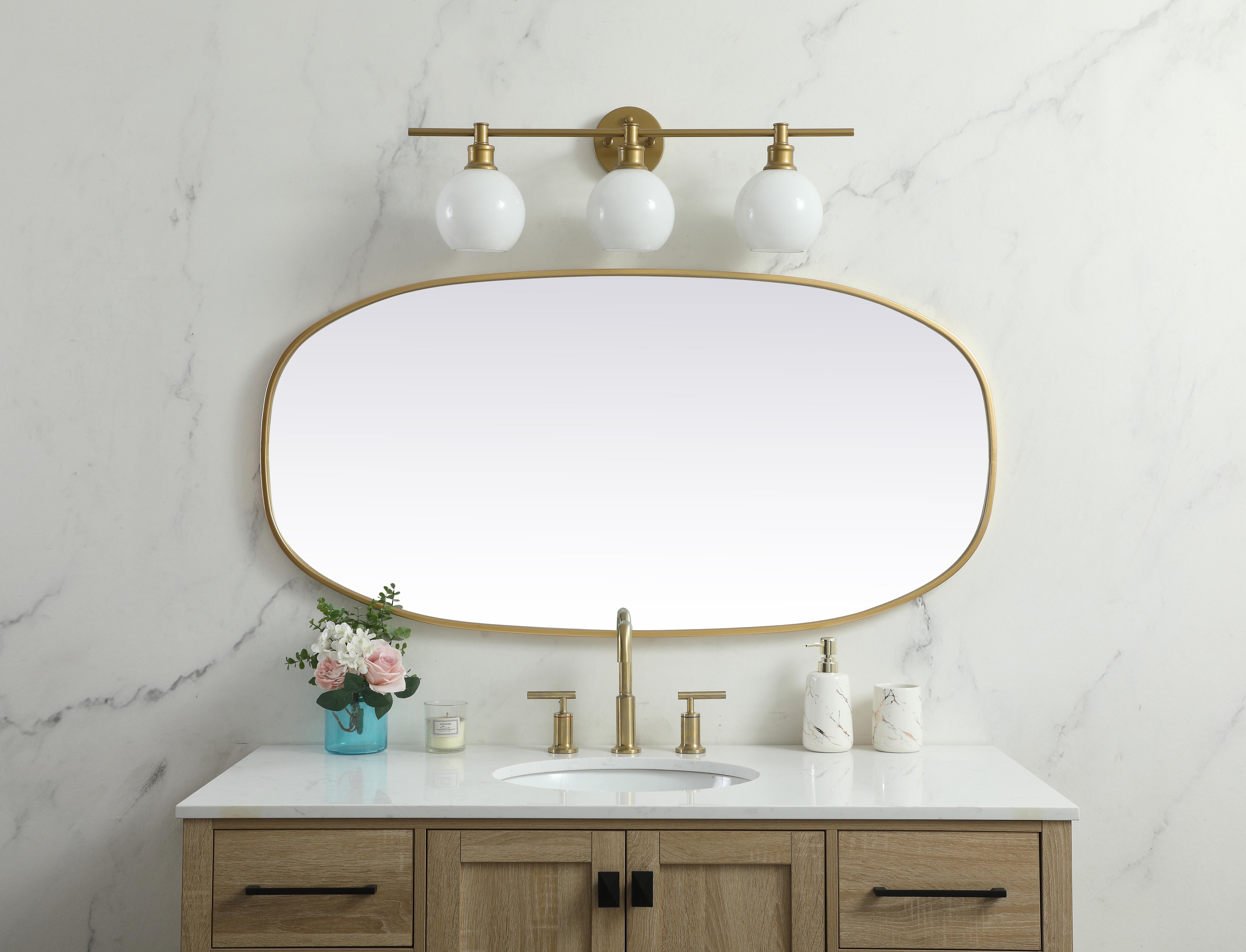 Crafted of metal, this mirror strikes a rounded corner silhouette. Instantly open up any space in your home with this minimalist wall-mounted mirror. Its slender, clean-lined frame sports a classic finish, while the glass mirror within features a flat, for a brilliant reflection, letting the light bounce off to expand your space. Designed in an oblong shape, this metal-frame mirror showcases in the three available satin finishes in black, brass, or silver. Mount this work of art in any room of your choice for added visual impact. Collection: Brynn Rooms: living room, entryway, bathroom, office Finish: Brass Width: 1.00" Height: 48.00" Length: 24.00" Weight: 20.00 lb Material: iron and MDF Country of Origin: China Manufacturer Warranty: 1 year limited - alternate view