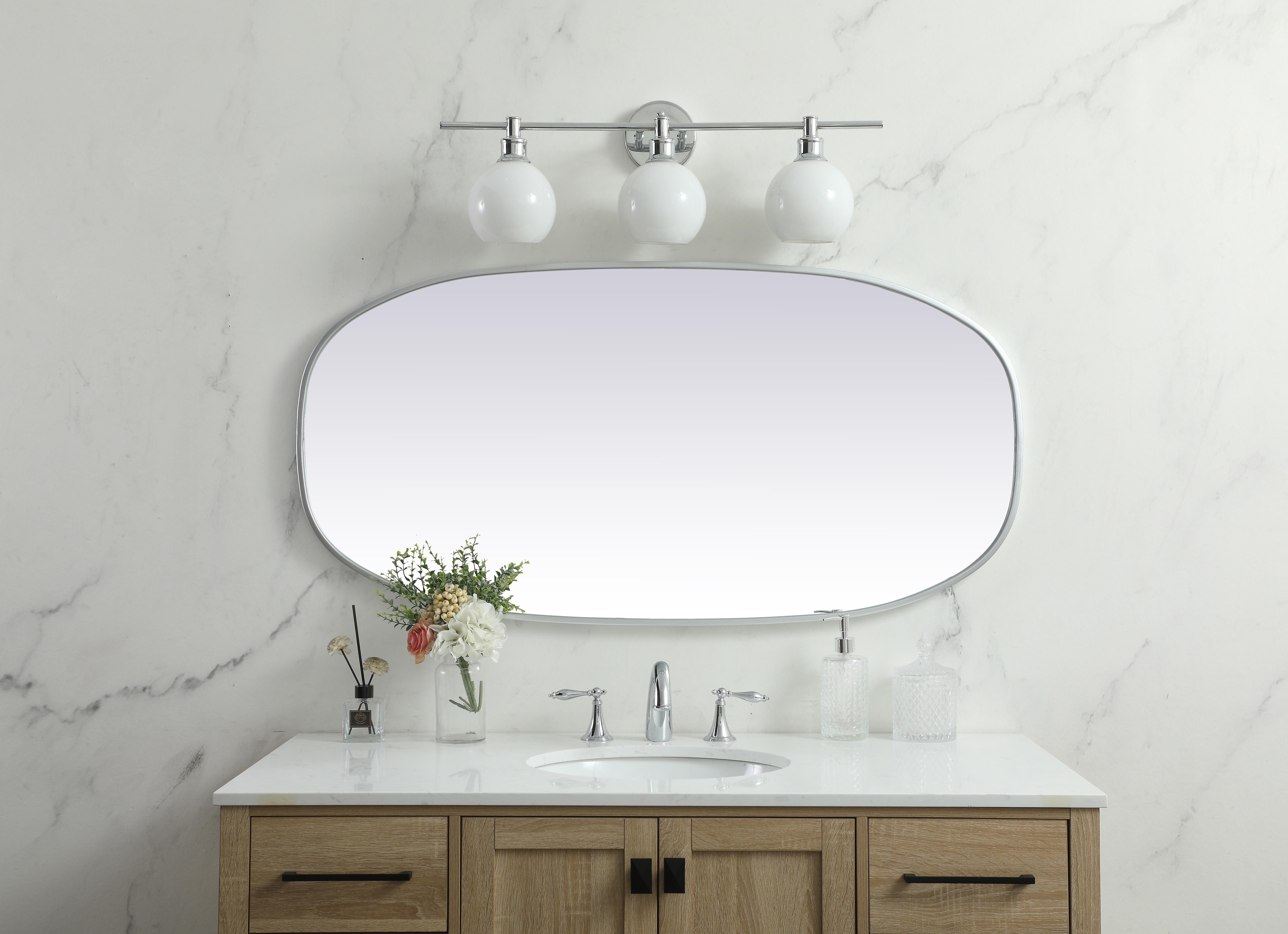 Crafted of metal, this mirror strikes a rounded corner silhouette. Instantly open up any space in your home with this minimalist wall-mounted mirror. Its slender, clean-lined frame sports a classic finish, while the glass mirror within features a flat, for a brilliant reflection, letting the light bounce off to expand your space. Designed in an oblong shape, this metal-frame mirror showcases in the three available satin finishes in black, brass, or silver. Mount this work of art in any room of your choice for added visual impact. Collection: Brynn Rooms: living room, entryway, bathroom, office Finish: Silver Width: 1.00" Height: 48.00" Length: 24.00" Weight: 20.00 lb Material: iron and MDF Country of Origin: China Manufacturer Warranty: 1 year limited - alternate view
