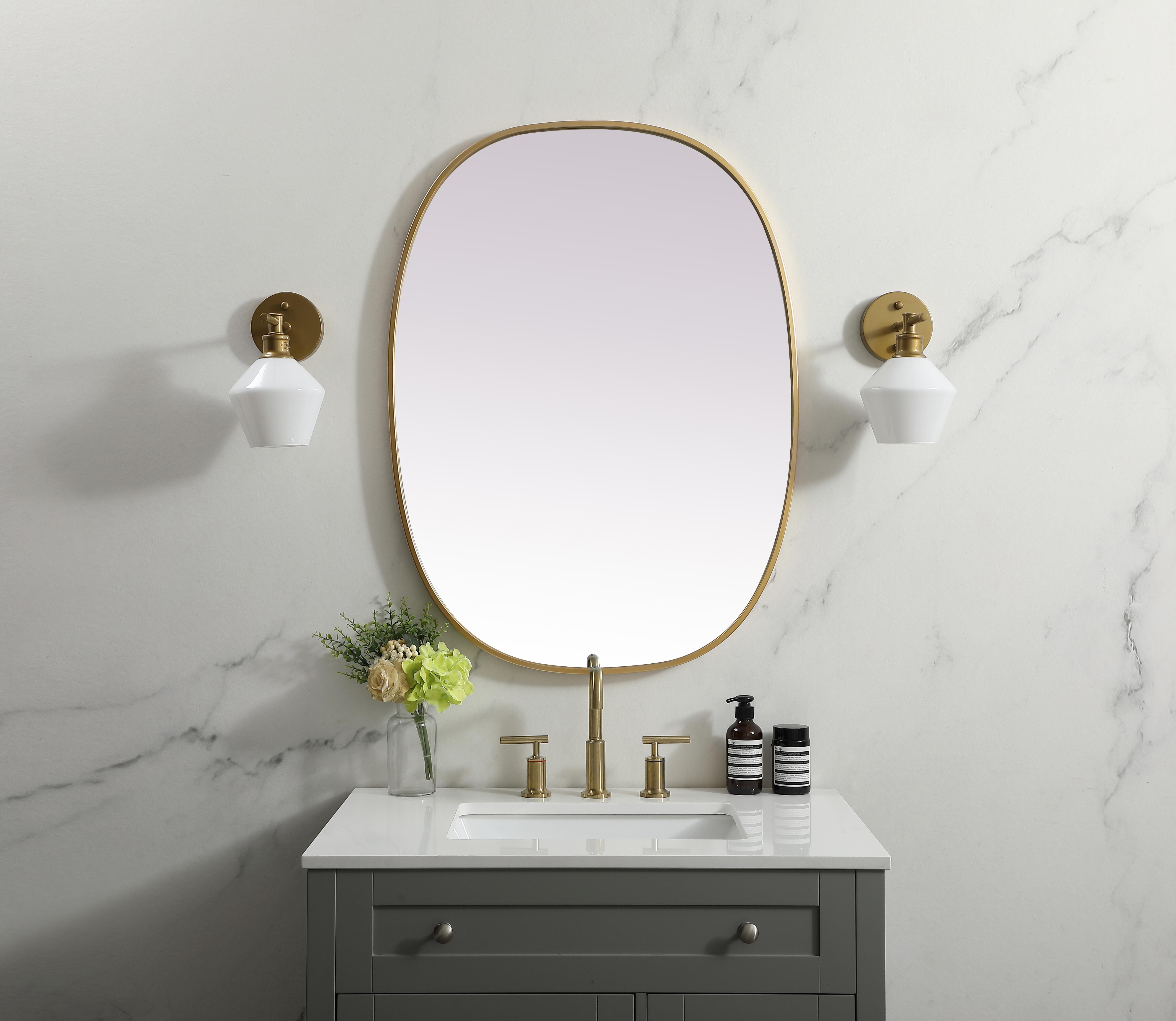 Crafted of metal, this mirror strikes a rounded corner silhouette. Instantly open up any space in your home with this minimalist wall-mounted mirror. Its slender, clean-lined frame sports a classic finish, while the glass mirror within features a flat, for a brilliant reflection, letting the light bounce off to expand your space. Designed in an oblong shape, this metal-frame mirror showcases in the three available satin finishes in black, brass, or silver. Mount this work of art in any room of your choice for added visual impact. Collection: Brynn Finish: Brass Width: 27.00" Height: 36.00" Length: 36.00" Weight: 16.00 lb Material: iron and MDF Country of Origin: China Manufacturer Warranty: 1 year limited - alternate view