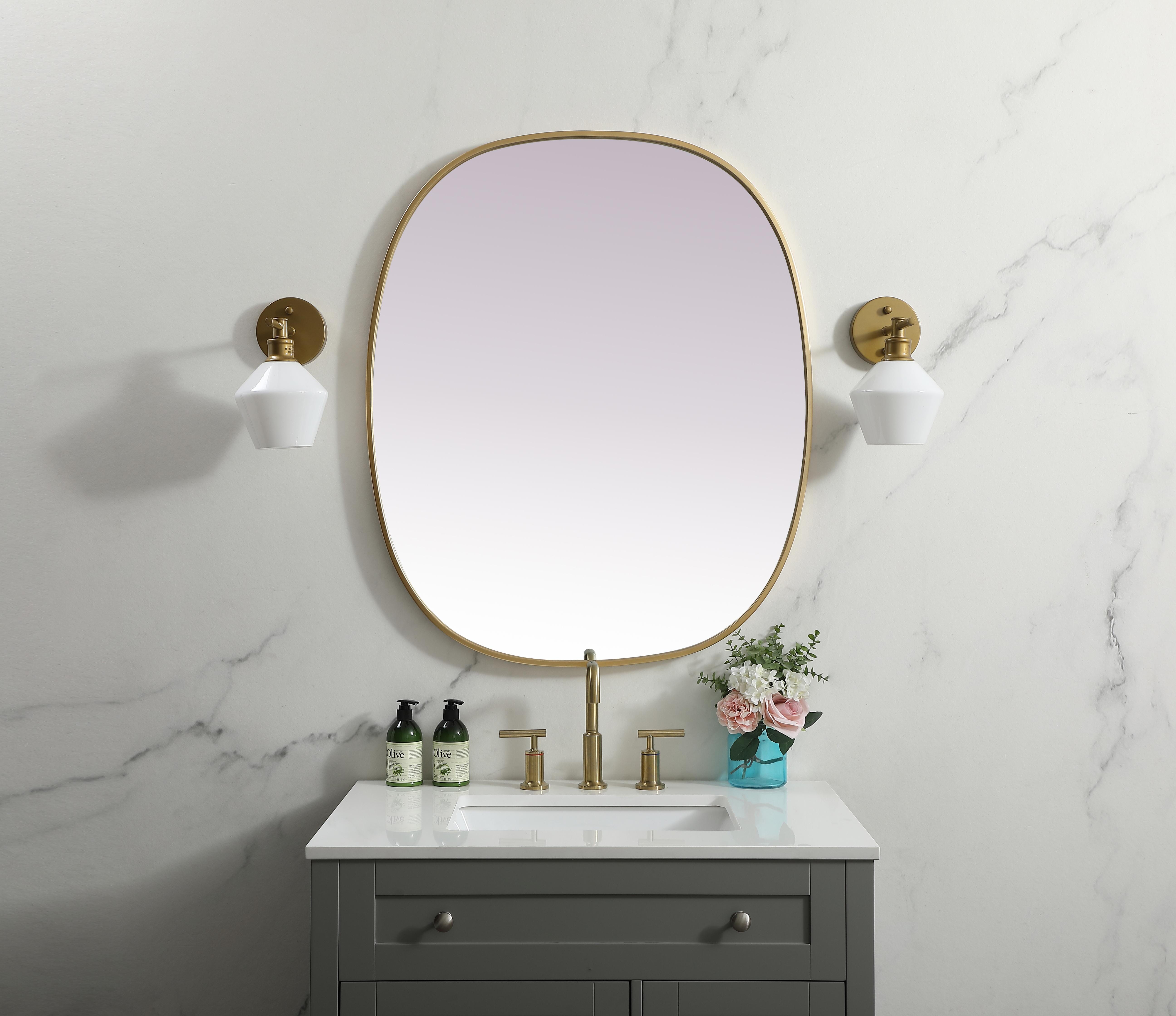 Crafted of metal, this mirror strikes a rounded corner silhouette. Instantly open up any space in your home with this minimalist wall-mounted mirror. Its slender, clean-lined frame sports a classic finish, while the glass mirror within features a flat, for a brilliant reflection, letting the light bounce off to expand your space. Designed in an oblong shape, this metal-frame mirror showcases in the three available satin finishes in black, brass, or silver. Mount this work of art in any room of your choice for added visual impact. Collection: Brynn Finish: Brass Width: 30.00" Height: 36.00" Length: 36.00" Weight: 18.00 lb Material: iron and MDF Country of Origin: China Manufacturer Warranty: 1 year limited - alternate view