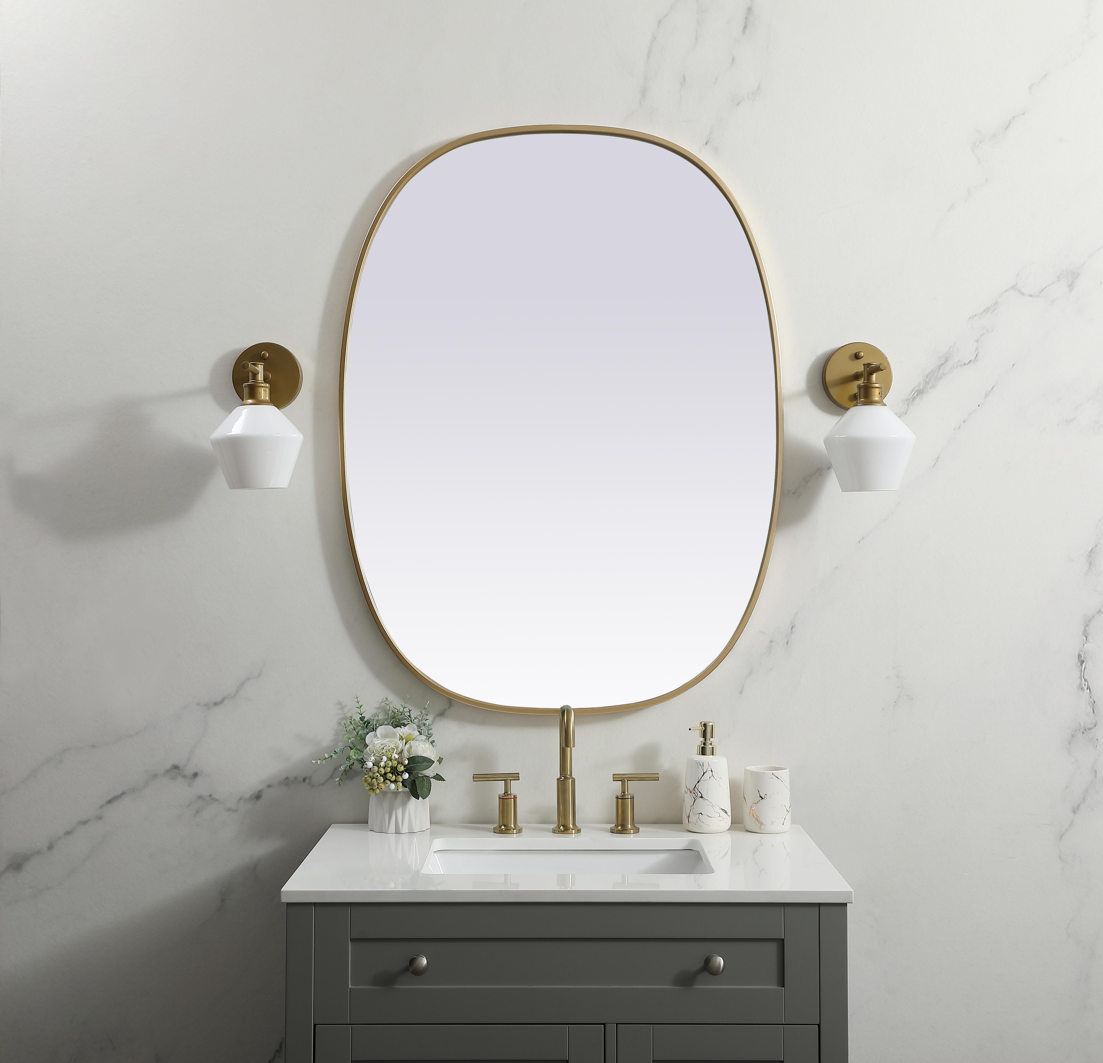 Crafted of metal, this mirror strikes a rounded corner silhouette. Instantly open up any space in your home with this minimalist wall-mounted mirror. Its slender, clean-lined frame sports a classic finish, while the glass mirror within features a flat, for a brilliant reflection, letting the light bounce off to expand your space. Designed in an oblong shape, this metal-frame mirror showcases in the three available satin finishes in black, brass, or silver. Mount this work of art in any room of your choice for added visual impact. Collection: Brynn Finish: Brass Width: 30.00" Height: 40.00" Length: 40.00" Weight: 19.00 lb Material: iron and MDF Country of Origin: China Manufacturer Warranty: 1 year limited - alternate view