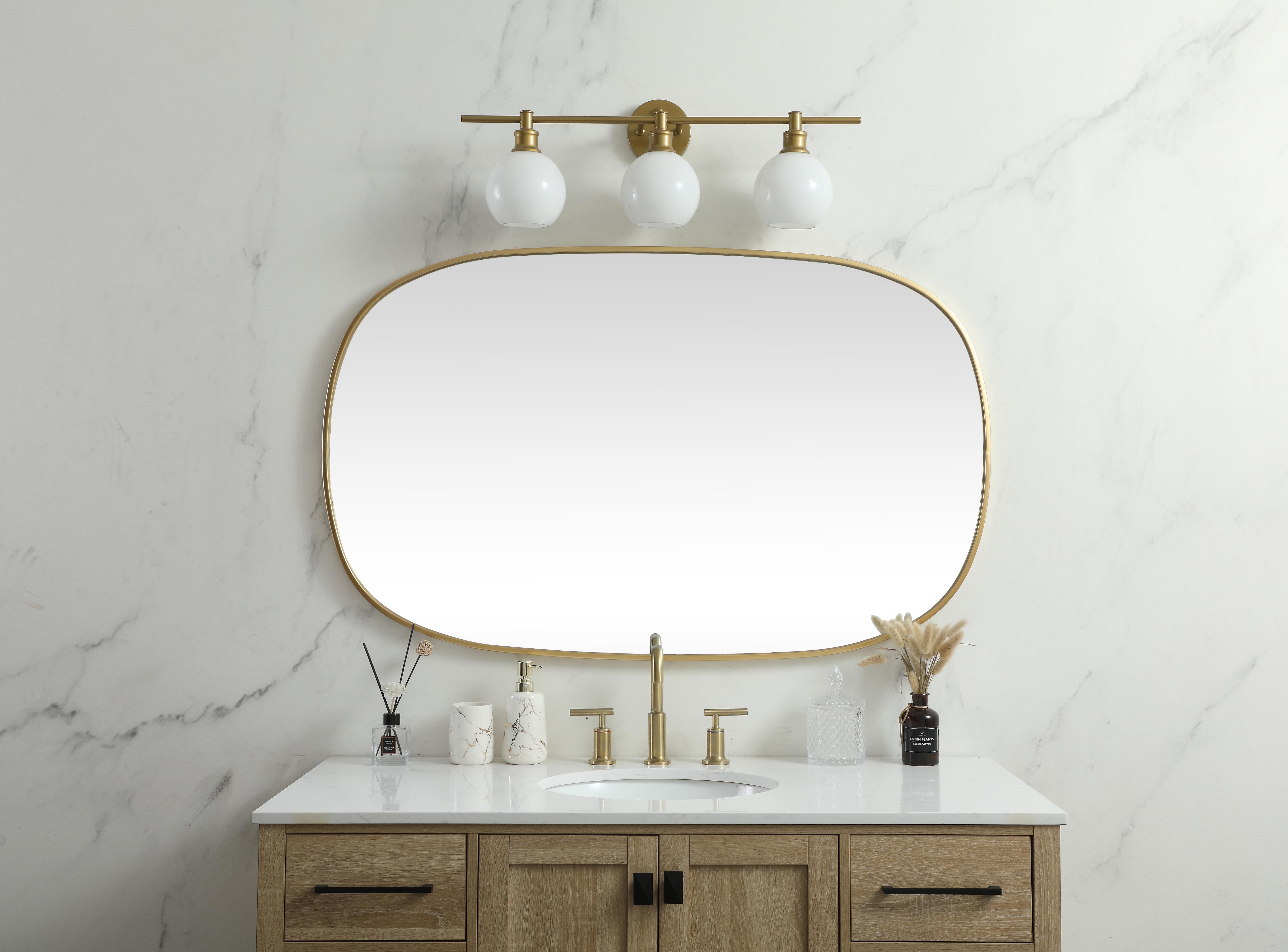 Crafted of metal, this mirror strikes a rounded corner silhouette. Instantly open up any space in your home with this minimalist wall-mounted mirror. Its slender, clean-lined frame sports a classic finish, while the glass mirror within features a flat, for a brilliant reflection, letting the light bounce off to expand your space. Designed in an oblong shape, this metal-frame mirror showcases in the three available satin finishes in black, brass, or silver. Mount this work of art in any room of your choice for added visual impact. Collection: Brynn Rooms: living room, entryway, bathroom, office Finish: Brass Width: 1.00" Height: 48.00" Length: 30.00" Weight: 25.00 lb Material: iron and MDF Country of Origin: China Manufacturer Warranty: 1 year limited - alternate view