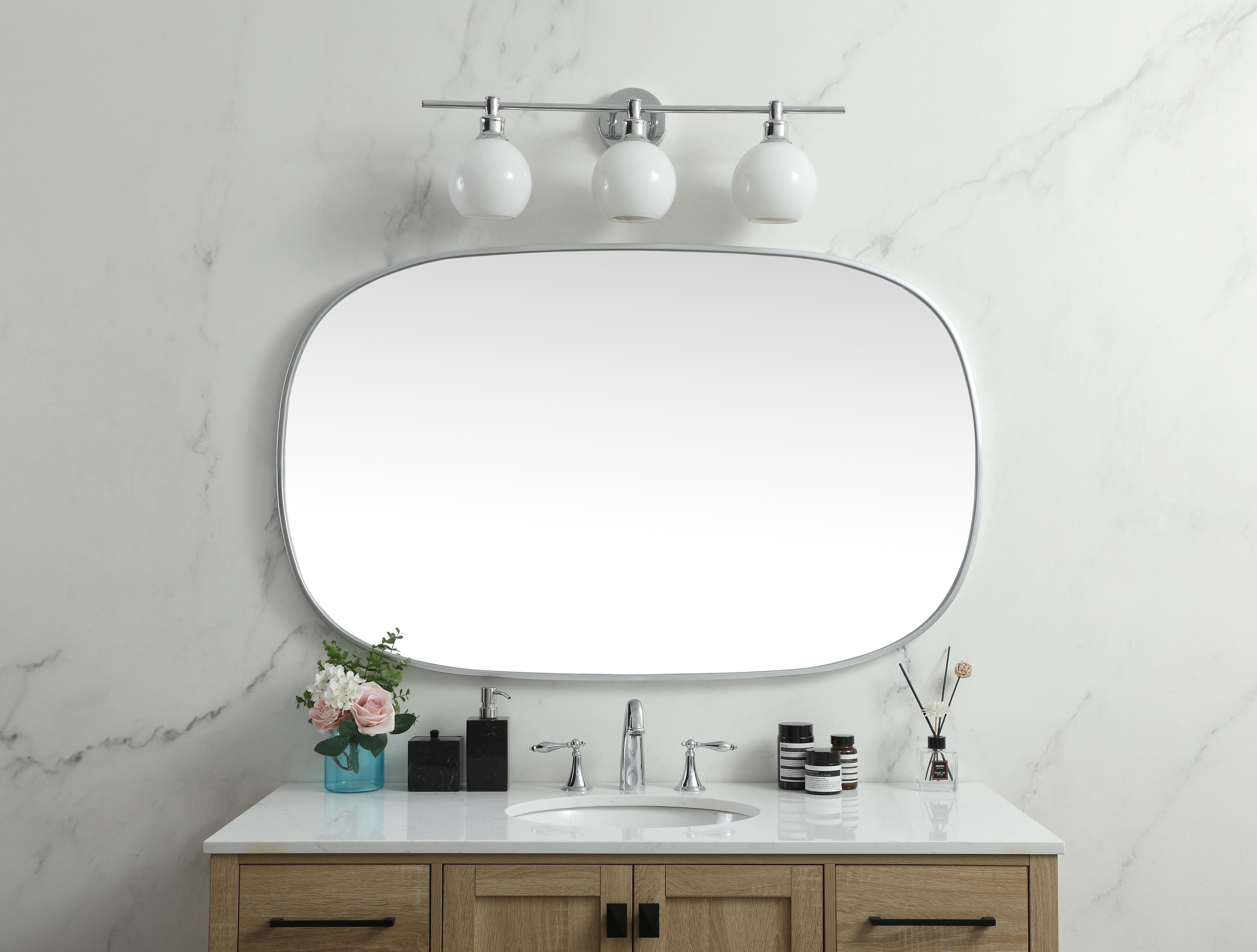Crafted of metal, this mirror strikes a rounded corner silhouette. Instantly open up any space in your home with this minimalist wall-mounted mirror. Its slender, clean-lined frame sports a classic finish, while the glass mirror within features a flat, for a brilliant reflection, letting the light bounce off to expand your space. Designed in an oblong shape, this metal-frame mirror showcases in the three available satin finishes in black, brass, or silver. Mount this work of art in any room of your choice for added visual impact. Collection: Brynn Rooms: living room, entryway, bathroom, office Finish: Silver Width: 1.00" Height: 48.00" Length: 30.00" Weight: 25.00 lb Material: iron and MDF Country of Origin: China Manufacturer Warranty: 1 year limited - alternate view