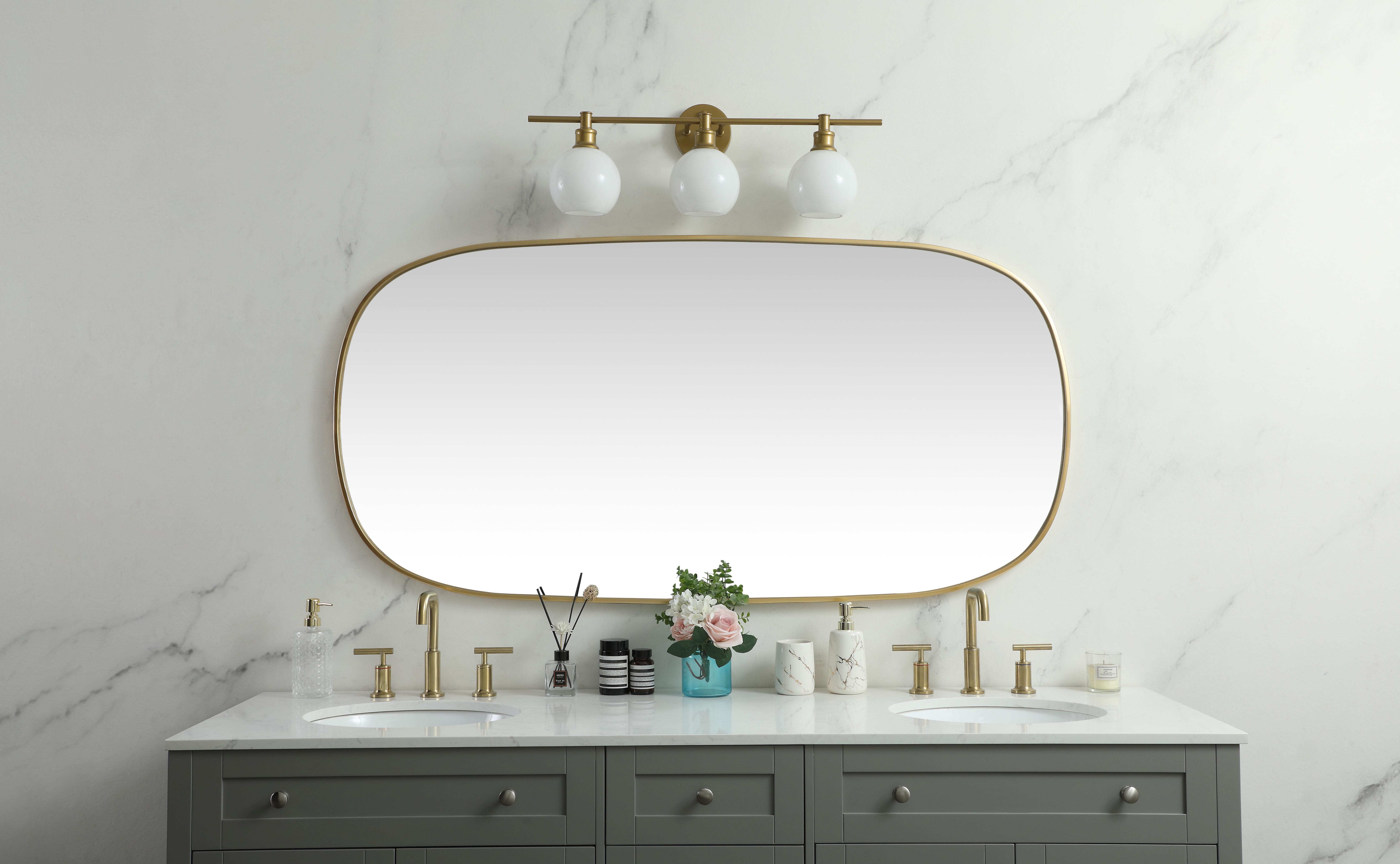 Crafted of metal, this mirror strikes a rounded corner silhouette. Instantly open up any space in your home with this minimalist wall-mounted mirror. Its slender, clean-lined frame sports a classic finish, while the glass mirror within features a flat, for a brilliant reflection, letting the light bounce off to expand your space. Designed in an oblong shape, this metal-frame mirror showcases in the three available satin finishes in black, brass, or silver. Mount this work of art in any room of your choice for added visual impact. Collection: Brynn Rooms: living room, entryway, bathroom, office Finish: Brass Width: 1.00" Height: 60.00" Length: 30.00" Weight: 31.00 lb Material: iron and MDF Country of Origin: China Manufacturer Warranty: 1 year limited - alternate view