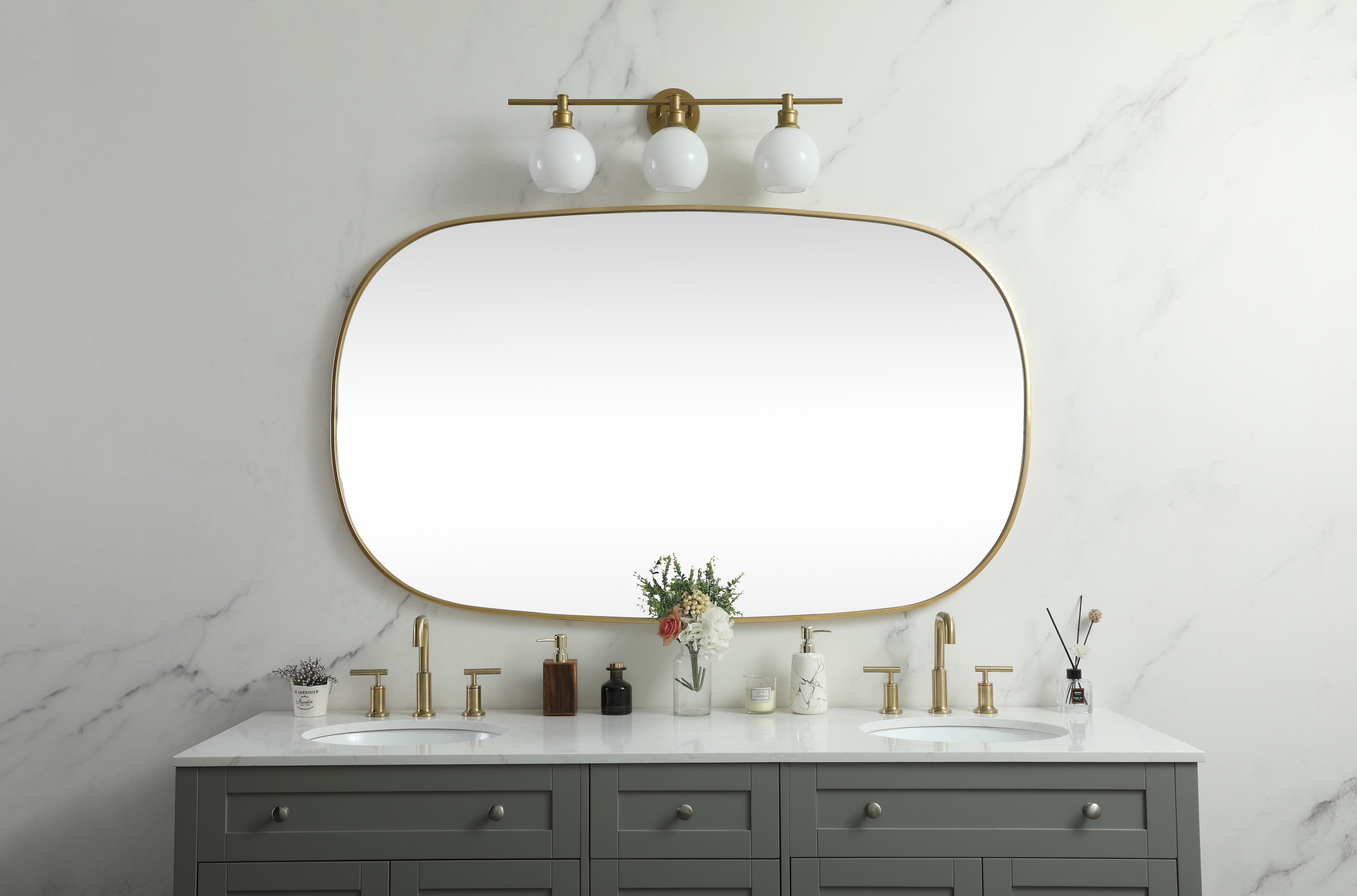 Crafted of metal, this mirror strikes a rounded corner silhouette. Instantly open up any space in your home with this minimalist wall-mounted mirror. Its slender, clean-lined frame sports a classic finish, while the glass mirror within features a flat, for a brilliant reflection, letting the light bounce off to expand your space. Designed in an oblong shape, this metal-frame mirror showcases in the three available satin finishes in black, brass, or silver. Mount this work of art in any room of your choice for added visual impact. Collection: Brynn Rooms: living room, entryway, bathroom, office Finish: Brass Width: 1.00" Height: 60.00" Length: 36.00" Weight: 37.00 lb Material: iron and MDF Country of Origin: China Manufacturer Warranty: 1 year limited - alternate view