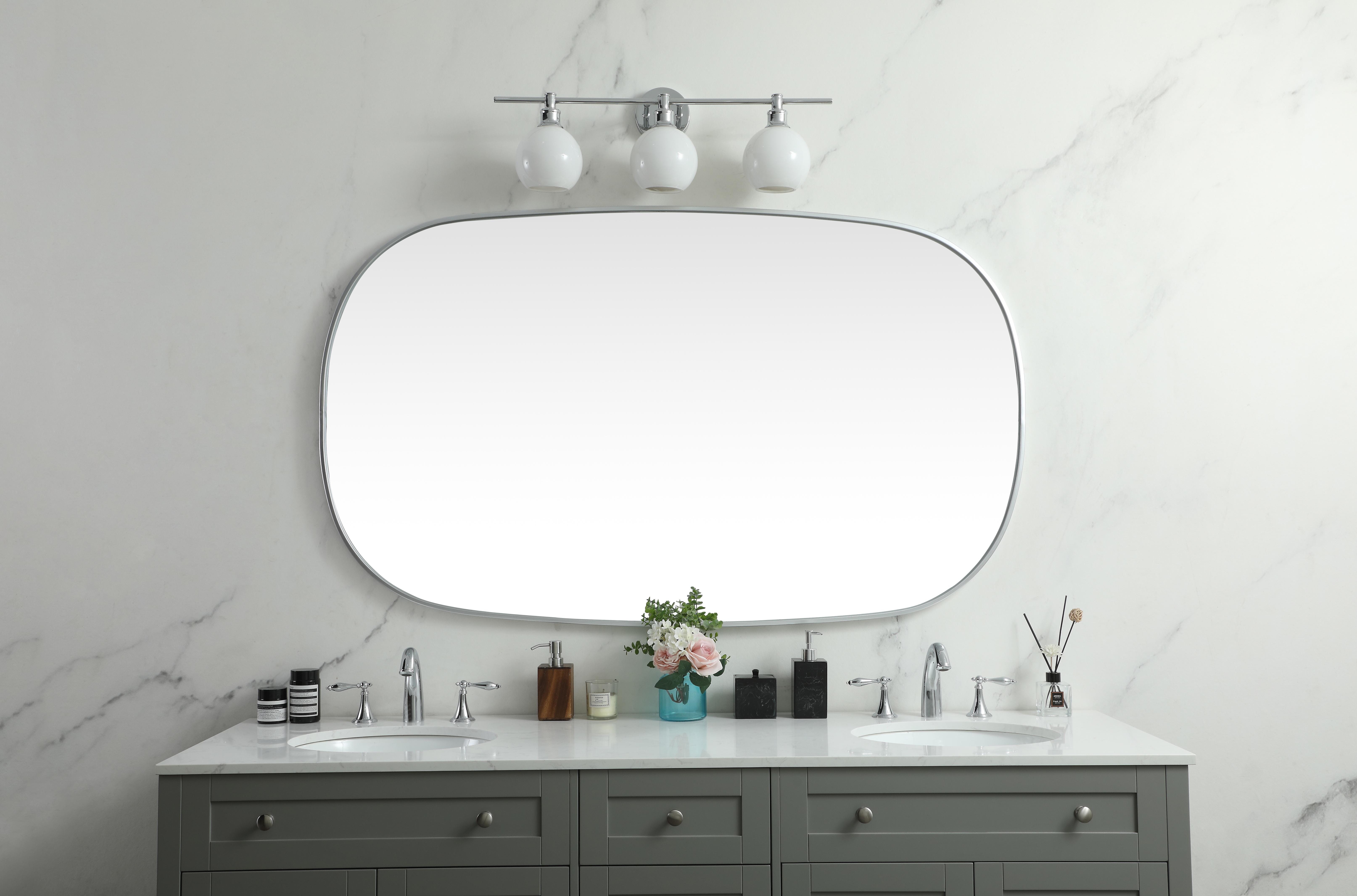 Crafted of metal, this mirror strikes a rounded corner silhouette. Instantly open up any space in your home with this minimalist wall-mounted mirror. Its slender, clean-lined frame sports a classic finish, while the glass mirror within features a flat, for a brilliant reflection, letting the light bounce off to expand your space. Designed in an oblong shape, this metal-frame mirror showcases in the three available satin finishes in black, brass, or silver. Mount this work of art in any room of your choice for added visual impact. Collection: Brynn Rooms: living room, entryway, bathroom, office Finish: Silver Width: 1.00" Height: 60.00" Length: 36.00" Weight: 37.00 lb Material: iron and MDF Country of Origin: China Manufacturer Warranty: 1 year limited - alternate view