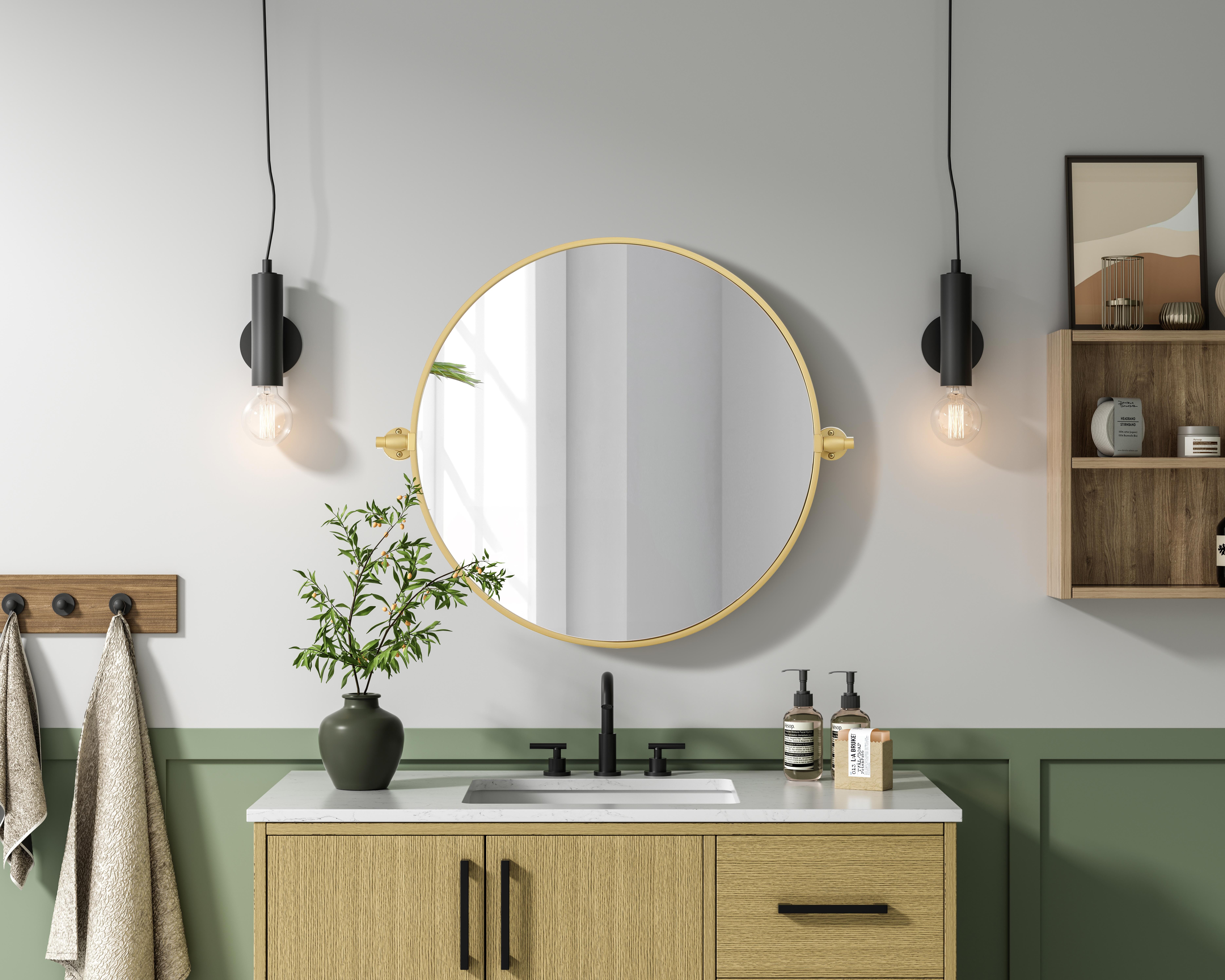 Elevate your space with the perfect blend of form and function—this sleek pivot mirror is designed to move with you. Crafted from durable iron with a sturdy MDF backing, it offers both stability and style. The 8-degree adjustable pivot allows for a customized viewing angle, making it ideal for bathrooms, bedrooms, and beyond. Finished with a hand-painted touch, this mirror is available in three elegant shades: black, silver, and brass, effortlessly complementing a range of interior aesthetics. Its modern round silhouette brings a timeless, minimalist appeal, making it a versatile piece for any room—whether placed in a living room, office, or entryway. Designed for effortless installation, this mirror comes with all necessary mounting brackets and screws, so you can upgrade your space in minutes. Whether you're seeking a functional bathroom essential or a sophisticated statement piece, this adjustable pivot mirror delivers in both style and practicality. Collection: Amoura Rooms: Bathroom Finish: Brass Width: 24.00" Height: 24.00" Weight: 10.00 lb Extension from Wall: 3.00" Material: Iron and MDF Country of Origin: China Safety Rating: Damp Manufacturer Warranty: 1 year limited - alternate view